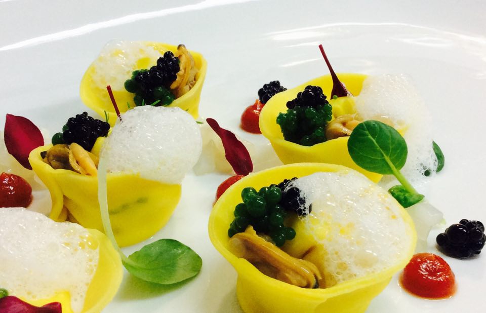 Photogallery






Gianni Dezio, Tosto, Atri (Teramo)

Tortelli with artichokes, fondue of pecorino from Atri, mint and liquorice. Liquorice and mint unite so as to enhance one of the most important vegetables in Italian cuisine









Valerio Centofanti, L'Angolo d'Abruzzo, Carsoli (L'Aquila)

Pappardelle with gelded lamb with pecorino from Alta Valle del Turano. The lamb is gelded before it is two months’ old and raised for 18 months. A dish full of emotions and sensations that has disappeared from Italian kitchens (in the picture, the gelded lamb)









Niko Romito, Reale Casadonna, Castel di Sangro (L'Aquila)

Because it’s the proof that constant research in the kitchen (in this case applied to cutting and macerating cabbage) can pull down the "wall" of vegetal representation and give new and powerful solutions in terms of structure and taste. Creating surprise and deep emotion. For me, it represents a new phase









Mattia Spadone, La Bandiera, Civitella Casanova (Pescara)

Vegetables cooked in salt. I worked on cooking in salt only using vegetables (from our kitchen garden). It may seem banal but I’ve been working on this for over 3 months: these are roots and leaves presented in different textures, crispy, mashed and thinly diced









Patrizia Corradetti, Zenobi, Colonnella (Teramo)

Meat and spinach ravioli with Neapolitan genovese sauce. I needed to include in the mid-August menu a first course with filled pasta that would still be traditional









Nadia Moscardi, Elodia nel Parco, L'Aquila

Textures of pasta and vegetable garden. It is inspired by Le Virtù, an ancient soup from Abruzzo that was made by the bride for the future mother-in-law to prove her virtues in the kitchen










William Zonfa, Magione Papale, L'Aquila

Castratissimo. Gelded meat is very popular in Abruzzo. The sauce you see is a dehydrated “veil of gelded meat sauce”, wrapping the soft meat. Upon contact with the heat and humidity of the meat, it is rehydrated and gives life to the memory of meat chops coming out from the sauce itself









Cinzia Mancini, Bottega Culinaria Biologica, San Vito Chietino (Chieti)

Pescatrice noir. My territory and the elements defining it: sun, rocks, sea, wind and fire









Stefania Di Pasquo, Locanda Mammì, Agnone (Isernia)

Raspberry mousse with caramelised white chocolate and hazelnuts. It’s a non-sweet sweet, a dessert that represents a change from the classic desserts I have in the menu. It represents my current desire for change









Felice Sgarra, Umami, Andria

Cream of cannellini beans and scampi with lemon sourness. A fresh course but also one that is suitable for every occasion
 









Antonio Scalera, La Bul, Bari

Home-smoked mackerel, toasted walnuts, jam and gelatine of friggitelli peppers. Blue tailed fish: poor, from the tradition and history of Apulia. Cinderella becomes the queen on our table









Giovanni Lorusso, Memory resort, Bisceglie (Barletta, Andria e Trani)

Sea bass, smoked Jerusalem artichoke, green affilla and sesame praliné. The fish, the aroma of almonds, the sauce of smoked Jerusalem artichoke, the aroma of the baby peas that have just sprouted and the sesame praliné adding sweetness and balsamic notes









Teresa Galeone Buongiorno, Già Sotto l'Arco, Carovigno (Brindisi)

Pink gnocchi with pesto heart, ricotta and puffed beetroot. A voluptuous mix of colours and flavours









Antonella Ricci and Vinod Sookar, Al Fornello da Ricci, Ceglie Messapica (Brindisi)

Drops of ricotta on a pesto of wild chards, crispy pancetta and pepper smoked with apple wood. The brackish note of the chards enhances the milky taste of the ricotta, strictly produced by Mrs Anna Argentiero. In this season there’s the best ricotta and wild chards. In the menu until April









Francesco Nacci, Botrus, Ceglie Messapica (Brindisi)

I wanted to be a chop. Smoked carpaccio with olive leaves where the "thinness" substitutes the "long cooking time" and the creams with classic flavours (tomato, pecorino, capers) give it the softness and succulence of a homemade "braciola al sugo" (chop with tomato sauce)
 









Filomena Silibello, Cibus, Ceglie Messapica (Brindisi)

Quail soup with simeto durum wheat, chicory and wild scattapietre. The hunting tradition of this territory and the richness of wild herbs induced our grandmothers to serve all that nature had to offer locally









Salvatore Amato, Borgo Valle Rita, Ginosa (Taranto)

Risotto with burnt garlic, oil, chilli pepper and sea urchins. Our agricultural tradition and all the elegance of the sea melt in a dish capable of recalling the best childhood memories









Alfredo De Luca, Malcandrino, Lecce

Risotto, sorbet of red onion from Tropea, chicken liver, radishes and wild fennel. The well-established match of onions and liver becomes an explosion thanks to rice









Angelo Sabatelli, Angelo Sabatelli, Monopoli (Bari)

Squid, allievo (baby squid), almond and lemon. A dish that encloses all of Apulia in 3 ingredients: squid (in two versions: the adult for the veil and the baby served raw), candied lemon from Gargano and cream of almonds from Toritto (photo by Lello D'Anna)









Pietro Zito, Antichi Sapori, Montegrosso (Andria) 

Black chard lasagne stuffed with pancotto with turnip tops and potatoes. For us, real farmers, who grew up in the old countryside, vegetarian and vegan cuisine were everyday life. A few days ago I introduced this deceivable dish in the menu: there’s no meat, no egg, no cheese. Still, it is good and looks good









Enzo Florio, Da Tuccino, Polignano a Mare (Bari)

Crispy red mullet with almonds. The aroma of the seaside in Apulia enclosed in a dish, plus potatoes from Polignano









Andrea Cannalire, Cielo del Relais La Sommità, Ostuni (Brindisi)

Egg and Flour (dedicated to my father). My father has a poultry farm and he still produces eggs and for me this was the biggest homage I could give him because he gave me the chance to become what I am today









Salvatore Carlucci, La Barca di Ciro, Pulsano (Taranto)
Oyster Coconut & Passion. It’s an oyster marinated in seawater, aromatised with ginger and pepper from Jamaica, immersed in fresh coconut milk and served with a passion fruit gel









Stefano Di Gennaro, Quintessenza, Trani

Red mullet, orange, carrot and sweet and sour onion. Straight to the essence of the sea and the deepness of the earth: eating the red mullet, one can perfectly sense the sea, the deepness of the earth refers to cultivating onions and carrots









Gaetano Servidio, Menelao a Santa Chiara, Turi (Bari)

Cream of chickpeas from Altamura with chargrilled king trumpet mushrooms and pastry with smoked scamorza. A historic dish at our restaurant: strong and clear flavours, a rustico that gets rid of technique (which as chefs we always seek obsessively). It encloses the warmth of the people of Apulia









Gianfranco Bruno, Lo Scrigno dei Sapori alle Masserie del Falco, Forenza (Potenza)

La podolica in transumanza. That is to say slowly-cooked cheek of podolica cow, mousse of fennels, hazelnuts and black tea with mandarin. The journey of a podolica cow – a typical meat from Basilicata, used for stews – which acquires new scents and textures









Luca Abbruzzino, Antonio Abbruzzino, Catanzaro

Sweetbreads, anchovies, honey, bergamot and capers. This dish respects my territory and my cooking philosophy, the perfect meeting of sea and earth and the enhancement of ingredients from Calabria such as bergamot, anchovies and honey
 






