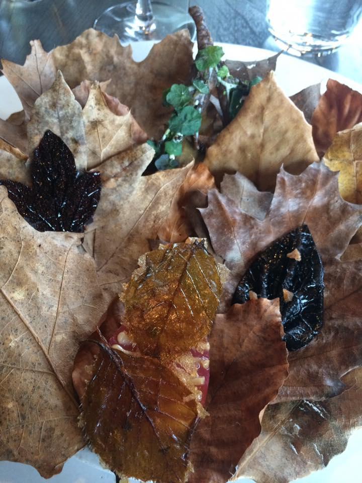 Photogallery






The traditional welcome at Noma: the chefs from the service kitchen greet the guests. In the middle, Italian Riccardo Canella, who will help us describing the last menu in detail (photo gallery by Luca Iaccarino and Gabriele Zanatta)









Warm broth of cloudberries. It’s the last welcome dish at Noma. It’s cold outside but as soon as you sit inside, you get warm thanks to this hot broth made with cloudberries enriched with rhubarb root oil. You dip a bouquet of hay, lemon thyme and mountain pine. Corroborating









Riccardo Canella brings a preview of what will follow









It’s a dish with seafood, including a huge (and alive) king crab, sea urchins and oysters









Apple of the season









Apple of the season. Once you open the shell, many small apple parisienne appear in a juice made with centrifuged, clarified apple scraps, seasoned with verbena and thyme. There’s also a purée of apples fermented in broth. The dish is finished with oxalis flowers, tagete and oil of blackcurrant wood, made by beating the blackcurrant branches with a hammer, so as to extract their essential oils. A very pleasant dish despite its complex idea.

"The first time I saw it ", added Canella, "I was struck because it reminded me of the stuffed apples they used to make at restaurant Bulesca in Selvazzano, Padua, in the early Eighties. Except in that case it was filled with rolls made with granny smith apple and prosciutto from Montagnana" 









Fresh sliced scallop. It’s a scallop taken from the fish tank and shelled a few moments before serving it. It is then sliced, brushed with a reduction of vegetable whipped butter with cucumber centrifuge juice, then reduced, and piso broth (that is to say miso with dehydrated peas).

The technique is the same used for the broth ice-clarification made famous in the Nineties by Heston Blumenthal at Fat Duck: you freeze the broth then hang a table cloth so as to obtain the “pure” part of the liquid. A trick that adds the same satisfying sensation of a meat jus to a vegetable broth. The scallop is finally dipped into a classic mussel broth. An incredible mouthful of seafood and umami









A Winter Platter. Hidden among the leaves, are four edible tastings







