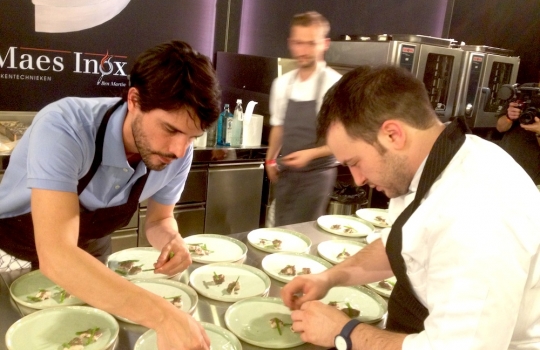 Photogallery






With 250thousand inhabitants, Gent (or Gand) is the third largest city in Belgium. With its canals and its laid back life, it competes with Bruges for the title most beautiful city in the Flanders 








The Sunday began at the Flemish Food Fest, a festival in which everyone was grilling all sorts of food. In the photo, the chef table with many of the chefs that were to be the protagonists of the Gelinaz! dinner








Colagreco, Redzepi and the kitchen-van. The location was kept secret until the beginning of the show, at around 7 pm








The two long tables set at the Icc in Gent. Three shifts: 1-8, 9-16, 17-24. We were so lucky we enjoyed them all








In the kitchen, works to dismember the chickens from Gent begin








"Even I don’t know what will happen tonight. And please remember: this is a performance, not a dinner", says Andrea Petrini, founder and curator of the event named after chef Fulvio Pieran-gelinaz and by Gorillaz, the temporary band that Blur’s Damon Albarn creates whenever he feels like it. The black sculpture underneath the Madonna is that of    Philippe Édouard Cauderlier (Antwerp, 1812-1887)








It all starts by quoting Kubrick and Eyes Wide Shot... Each dish is a song. And each of the three acts is separated by various artistic performances. In the dining room, men act as nothing is going on in front of their partners








First dish of the Gelinaz evening, Philippe Edouard Cauderlier’s Cold-hot chicken timbale, the original recipe from     1861. Roger Souvereyns of Scholteshof in Stevoort had the honour of performing it at the Icc in Gent








Inaki Aizpitarte     ’s Royal chicken kir, using all the ingredients in the original recipe. The wine is diluted in the chicken stock. The dish arrives together with     Wu Tang Clan’s rap








Anataoly Komm of Varvary in Moscow, lets us taste his Maki Roll behind the scenes








Komm’s Maki roll: chicken and vegetables wrapped in a turnip leaf. The sauce is made with walnuts, a Caucasian tradition








Agata Felluga ’s Lotus timbale. She’s the Italian sous chef at Chateaubriand in Paris, with a previous experience at Pascal Barbot’sAstrance. The dish is inspired by a Japanese sticky rice recipe, where the rice is cooked in a lotus leaf. Here, instead, there’s    Cauderlier’s chicken, together with miso, tamarind syrup, pork fat, soy sauce. A very complex dish.








Left, 32 year old Agata Felluga, born in Rome and adopted by the Ville Lumiére








Petter Nilsson’s Bread chicken, from the Gazzetta in Paris. It is made with all the cereals hens eat during their life: corn, hulled wheat, barley, rye and wheat. The photo of the bag is a portrait of the Danish chef’s creation








Massimo Bottura     is not in Gent, however, in a coup de theatre, his brother Paolo takes his place, here on the left with Alberto Buratti,     pastry-chef at Osteria Francescana. The chef from Modena explains in a video the reason behind his absence: "In Modena, his team is so finely     tuned that even my car-salesman brother can take my place", he jokes








Even in Bottura’s dish there’s no traditional chicken: it’s called Chicken, chicken, where are you? It is the re-interpretation     of the classic chicken salad, with a stock made with roasted chicken below, and a cotechino (cooked pork sausage) and agar-agar gelatine with very small dices of peas, carrots, potatoes, red and yellow peppers, onions, tomatoes... in the background, "What about the noise?" by    John Cage strikes us








Pea tendrils with chicken and mint aspic     by Blaine Wetzel, once a pupil of Redzepi, today back home in Lummi Island, a paradise in the middle of nowhere, in     Washington state. The tendrils are grilled. A great dish, with a super balance between smoke, balsamic and acid notes








Chia and chicken with tiger milk, turnips and coca leaves , that is to say "The chicken of Gent meets South America", a journey of the mind, from the Pacific ocean to the Andes to the Amazon forest led by Peruvian    Virgilio Martinez





