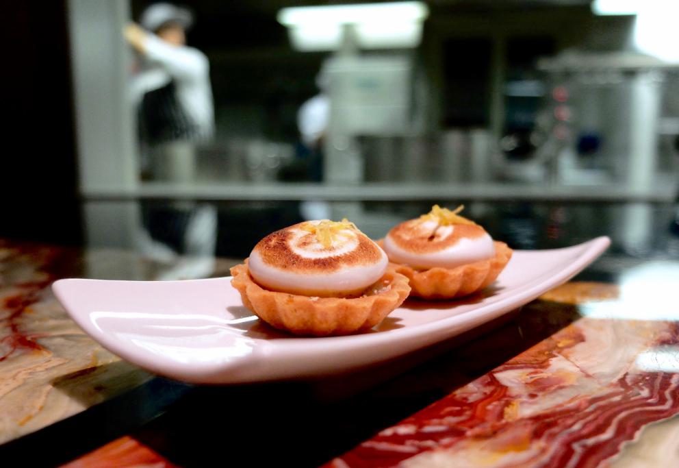 Photogallery






A new Lorenzo Cogo at the new El Coq, since July 2016 in the heart of Vicenza









At the entrance, the Carlton library by Ettore Sottsass, a great designer, founder of the  Memphis Group. In fact, it is entirely made in sugar, the work of artist Marco Chiurato

 









We get to the first floor: the perspective at the entrance recalls the depth of Palladio’s works









The elegant dining room









Precious cutlery by Giò Ponti for Sambonet. Everything is studied: the colour of the tablecloth is inspired by the roof of the Basilica Palladiana









The view from the dining room...









...and from the kitchen









Let’s start: Cherry tomato, angustura, vegetable jus. All the photos of the dishes are by Tanio Liotta









Beetroot macaroons with radicchio and Béarnaise sauce with mint 









Choux pastry with peanut cream and dried bacon 









Doughnut with goat cheese and curry cream: the last appetizer









Fondale marino, scalogno, salmone e salicornia: the shallot is chargrilled, there’s peppermint mousse, powdered salmon, and granita made with sea asparagus and orange bitter









Amberjack belly, rosola and peas: an improvisation based on what was available from the market. Fish and peas are chargrilled, then there’s a vinaigrette of pods and rosole, poppies









Chargrilled calamari, babaganush, bergamot and teriaki: the grill, once again. Cogo learnt its perfect use from Basque master Victor Arguinzoniz of Asador Etxebarri

 









Bosaga roe, yellow pepper, sake and ice camomile. Masterful what with complexity and elegance. Bosaga is a fish typical of Chioggia









Jerusalem artichoke "risotto", tuna bottarga and horseradish. There are many fake risottos available, such as the one with celeriac by Yoji Tokuyoshi and Salvatore Tassa or the vegetable one by Pedro Subijana. This is really perfect, with cream of Parmigiano and artichoke petals









Spaghetti with garlic and oil, hazelnut milk and seafood, with caviar of iced extra virgin olive oil and sea fennel. Beautiful, masterful and quite good too









Gargato, squid liver, mousse of buffalo milk mozzarella and ginseng. Gargato is a small maccherone. A delicious dish









Iceberg is an interlude: the salad is soaked in amaro Alpestre, a herb spirit. Then powdered cassis









Veal liver, wild asparagus, San Giuseppe, a typical spirit from Vicenza. Plus hop gel, cranberries and bran. Perfect harmony









Sweetbreads, radicchio and yogurt with herbs: the sweetbreads are cooked in hay, the radicchio is grilled. There’s balance, flavour, structure, elegance in every dish. Enrico Bartolini comes to mind









Piglet pluma, tofu, black garlic, rocket salad cream, turnip tops and ravette, that is to say wild baby radicchio. «There’s a man who gets them for me at over 1,600 metres, on the mountains above Marano Vicentino. He digs them out of the snow»









Pane e olio, that is to say bread gelato with extra virgin olive oil, celery seeds and candied walnut. «It’s my homage to Marano Vicentino. I created it the day I said goodbye». Cogo opened in Vicenza on the 19th of July 2016, the day of his 30th birthday









Artichoke gelato, barley and crispy coffee: the desserts are of the same (very high) standards as all the rest. The same goes for the service, handed to Fabio Lanaro and Stefano Campaniello






