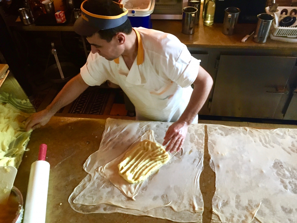 Photogallery






Breakfast with koulouri: you can find it all over town, we've chosen a kiosk between Korai and Stadiou, a stone's throw away from the university and not far from Psiri, the market area








Second stop, at Krinos (Aiolou 87): since 1922 it is the temple of loukoumades, pancakes fried in sesame oil and covered in honey and chopped almonds (loukuma is a word of Arab origins meaning nibble). A 6-piece portion costs 3.60 euros








The meat and fish market at Varvakios Agora (Athinas 42, a short walk from Krinos)








Come and grab some lamb!








Meat and fish market








Seafood delicacies. It's important to visit the fish market early in the morning because the best products are soon sold to restaurants













Walking around Psiri, Athens food corner








A pedlar selling salepi, an Ottoman drink made with dried orchid tubers








Slow food








Halva, a popular cake from India to the East of the Mediterranean Sea, based on tahina, a sesame paste. The word halva comes from the ancient Jewish where it meant 