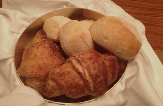 Photogallery






 
Modena’s colonnades, 186 thousand inhabitants and 3 restaurants with at least one Michelin star: Hostaria del Mare (1), Erba del Re (1) and Osteria Francescana (3 stars), our destination
 








Yellow and red tones prevail








The city still bears the signs of the May 2012 earthquake. On May 4th 2013, the day of our visit, a 3.8 magnitude earthquake was registered













By chance, Giuseppe Palmieri, maître and sommelier, appears from the grey door








Palmieri, 38, born in Matera. His first service in Francescana was on September 12th 2000








The old entrance to the restaurant, at number 24 in Via della Stella - as on the opening in 1995. It changed in September 2012: today you enter from number 22. Funnily enough, Google Maps is still set on the old entrance








The present entrance doors








Let’s start








After the latest renovations, the transit areas inside the Osteria appear as a contemporary art gallery








Mario Schifano’s world map








"Tourists", Maurizio Cattelan’s famous pigeons








Underneath the pigeons, Gavin Turk’s “Trashbag”








Three rooms, 12 tables, between 20 to 35 guests. 40% guests are Italian








Every table is illuminated by Davide Groppi’s Sampei lamp: if tables are moved, light follows








Francescana receives 150 reservations every day. But it also suffers from clients not showing up: on average, one table every week is booked but then guests don’t come








Right behind the kitchen, there’s the prêt-à-porter cellar








"In the central cellar, we only keep great vintages and larger bottles of what we consider to be great wines", Beppe Palmieri explains








1,600 wines are listed at Osteria Francescana, with a deep wine list which includes different vintages of the same wine








"A true celebration of wine "








The Ferrari coat, hanging in the cellar: Maranello is only 17 km away from Modena








Jean Todt, Michael Schumacher, Fernando Alonso: Ferrari’s “prancing horse” is at home in Via Stella








Gabrio Bini’s wines, from Pantelleria, a real fetish for Palmieri













Hanging from the ceiling, a nice selection of cured meats from Emilia








Bread made with mother yeast, the premise to a journey which will alternate great classics with very contemporary dishes








Massimo Bottura. Fifty years old last September, he is chef since 1986, the year of Trattoria del Campazzo in Nonantola. His first masters: Lidia Cristoni and Georges Cogny








He’s glowing: a few days ago his restaurant climbed, for the first time, onto the podium of the World's 50Best, a prize that is acquiring an increasing weight and authority. "The thing that makes me the happiest", he says, "is not so much the third place, but the fact that we’ve been in the highest positions for a few years now". True: 13th in 2009, 6th in 2010, 4th in 2011, 5th in 2012, 3rd in 2013








The now famous grey New Balance 993, a real emblem for the chef, friend of Jason Weis, president of the company in Massachusetts. The insole, however, is local: "In Emilia the sector is state-of-the-art", he says








"Are we ready?"








Almond granita with capers, bergamot and coffee cream 
Bottura and Palmieri’s journey across Italy starts from the bottom. And sails off from the Sicilian inland, with a classic granita which in Modena crumbles Adria-style, the wall that divides sweet from savoury, using the picklock of bitterness: Pantelleria capers, wild oregano but also bergamot, a coffee concentrate and vanilla scented salt. To pair with the first part of the meal, Sorriso di Cielo malvasia dei colli piacentini








Mediterranean Macaroon 
Next to the granita, two peculiar macaroons: the first is made with minced anchovies and sardines, the second with oysters and seaweeds. This is a classic scheme in Bottura’scuisine: his ironic turning the order of the dishes, from starter to dessert, upside down, and using popular raw materials instead of ingredients that are emblematic of élite cuisine. «While feet are sinking in the ground, the head is free to move everywhere», is one of his most famous quotes








Tempura of freshwater aulla with carpione ice-cream
Carpione ice-cream on a tempura of freshwater aulla – these fish are similar and slightly bigger than whitebait. The tempura is made by quickly placing the cold batter in boiling oil





