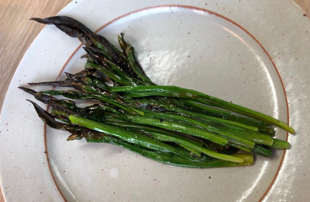 Photogallery






Noma 2.0 is in Christianshavn, the same neighbourhood as the first Noma. They’re 1.5 km apart, a 15 minutes’ walk. This picture shows the distance: to the right, there’s the warehouse of the old location (in Strandgade 93), to the left the smokestacks of Amager Bakke, the futuristic incinerator below which stands the new Noma (in Refshalevej 96)









Weather permitting, you can have a peaceful walk between the previous Noma to today’s Noma 









The new Noma is on an isthmus surrounded by canals. In the future they also want to reclaim some small parts for hydroponic farming









Bucolic scene with incinerator









Bikes left outside Noma. It’s the favourite means of transport among employees and interns









The long path taking you to the restaurant. The fence on the left shows how works are still in progress









On the two sides of the path there are the two new sections of the "Noma village", each with its specialty: grill, hot dishes, snacks, fermentations... In one month’s time, behind the fence we’ll have greenhouses, the test kitchen and the bread making area









To the left, before arriving at the restaurant, the future test kitchen. This will be run by Danish Mette Søberg with Riccardo Canella. "My first challenge?", reveals the latter, for a long time sous chef here, "is to work on the extraction of essential oils" 









The future Test Kitchen









The temporary gangway to the restaurant









Looking from the door to the restaurant, there’s a lake and the smokestacks puffing vapour from the Amager Bakke incinerator. It’s a futuristic project, both in terms of sustainability and architecture. It’s also known as Amager Slope or Copenhill, and its author is starchitect Bjarke Ingels, the same who designed the new Noma. Gradually opened in 2017, it transforms waste into electricity. The goal is to donate electricity to 62500 houses and hot water to 160000. It’s part of an ambitious project to transform Copenhagen into the first city in the world in terms of zero carbon dioxide emissions by 2025. By autumn this year, Amager Slope should open its ski slope, a climbing wall and a hiking track. You’ll be able to slalom on top of the incinerator









The windows from the dining room









Work is still in progress (photo taken on Thursday 22nd February 2018)









Traces of the old building, with barbwire. During WWII, they built bombs here









A view of the dining room at night (photo from Instagram/James Spreadbury)









The entrance to the restaurant









The usual ritual: a welcome from the entire staff, led by Rene Redzepi 









Behind the entrance, there are formaldehyde tanks with creatures from the abyss, shaped as in Damien Hirst’s works. The first image once you’re inside is to reproduce a Scandinavian village









The service kitchen is larger, more spacious and a completely open view from the dining room: "It’s the heart of our Scandinavian village", says Canella. There are 30 cooks working here now. 10 more, compared to the previous Noma









Large skylights above the cooks









There are currently more than 100 people working at Noma, of whom 63 are cooks - 26 employed, and 37 as interns









There’s fire in the kitchen, for the first time









On average, the dining room can host 40 people. "However", complains Redzepi, "there’s always someone who turns up with more people than the ones booked"









While the dining room is set, the outside space still need to be defined









The staff made the dining room decorations. There are no overly expensive designer objects









Dried fish









Seaweeds hanging from the ceiling









Dried octopus heads preserved in salt (with a balloon inside)














Bjarke Ingels and Redzepi’s plan included the wish to recreate a Danish farm









The luminous private dining room









The counter in the dining room. They drew the beams from the canals around the restaurant














The mise en place, bare and strictly without tablecloths









Water jug, candle, flower vase









A warm cloth, to begin with









Australian James Spreadbury, restaurant manager and partner at Noma









Welcome drink: Champagne extra brut Blanc d'Argile from Domaine Vouette et Sorbée









Sea Snail broth. The welcome dish at Noma is, as usual, a hot “soup”









Stefano Ferrano, from Torino, presents the following dish. There’s always a large Italian colony at Noma









Venus clams. Molluscs from Limfjord (Denmark) mixed with decorative clams, typical of Noma. Beside them, shells with blackcurrant oil and “Danish curry”, made with toasted coriander seeds, fennel and fennel seeds









The lid above the following dish. The mussels are not edible









Best of the mussel. Mussels open in a pan with water of fermented barley. «We recreate the mussel», says Canella, «using just the flaps, the best part». The paste is made with scraps from the mussel, cooked in smoked butter









The next dish is conceived and served by Riccardo Canella, the Paduan sous chef who conquered Redzepi, here with dining room intern Feline Hansen









Dried fruits and shrimps. In this case, the heads are not a decoration, but you must suck them –best not eat them because of the bones: they’re filled with a lovely prawn cream. The small crustaceans are still alive when they arrive on a ship straight from the Norwegian fjords









Inside, under the prawn broth skin, there’s fruits and vegetable preserved from the previous summer with raw prawns and gooseberry sauce with blackcurrant oil









How about beverages? There are three options, as usual: wine pairing (6 glasses plus a beer plus sake, 150 euros), juice pairing (juices and extracts, 110 euros) or a choice from the list. They recommend Champagne Chut... Libre from Val'Frison pour Dominique Derain, 50% Pinot Noir, 50% Chardonnay created by a couple who met at the old Noma. Well bodied, it will be a good match throughout the meal









As usual, the wine list starts with Champagne: the cheapest is 1400 crowns (190 euros)









White wines begin with labels from cold climates: first Austria, increasingly popular for its natural wines, then Germany, then all the others









How about Italy? Few names, among the white wines, from North and South









A dozen red/orange wines









Sea star, that is to say Cured trout roe and eggs, the emblem dish of this new era. They recommend moving the teaspoon from the heart to the edges of the tentacles. Aesthetics win over taste









Jellyfish. The jellyfish gel in the middle is in fact a clarified broth of calamari and recalls the texture of jellyfish. "We tried to cook jellyfish in 300 different ways but none was convincing so far". All around, pickled seaweed. The gel is almost tasteless, it serves to clean the palate after the pickles









Rene Redzepi himself presents the content of the first Seafood platter.









French style service with a small plate below for the empty shells









It’s made of two (per two) pieces: queen clam and mahogany clam









The Queen Clam is a very small variety of Norwegian scallop, seasoned with a vegetal reduction made with cucumber and peas miso. The red tip is the coral. "You should eat it using the top shell ", recommends Redzepi









The Mahogany clam is a centennial clam from the North Sea, very popular in Denmark and Iceland. «You can tell the age by the number of rings, like with trees», says Redzepi, «In 2007 they found one that was 450 years old. We’ve had it in the menu for a decade or so». The razor clam shell serves as teaspoon









Inside, there’s obviously not just a bare Mahogany. «We open it when the client arrives», says Canella, «remove the entrails and then slice it so as to preserve its firm texture». It’s seasoned with stir-fried gooseberry, capers of blackcurrants and blackcurrant sprouts preserved in vinegar. The sauce is made with mussel water









A note on the chairs: they’re more minimalistic. They’re no longer covered in sheepskin or leather from other Danish animals, in the style of Noma 1.0. The most significant element is the napkin: if you go to the toilet, they no longer replace it with a new one. There’s the old one, tied to the chair. "This is sustainability", they explain









The second seafood platter. It’s made of Sea cucumber and sour cream in various textures, including «chicharrones» (at 9 o’clock), sea urchins (at 12 and 3) and gigas oyster (at 6)









Sea urchins pressed in fresh cream and pumpkin seeds









Giga Oyster, a huge oyster from the Pacific, quickly steamed and garnished with pickles. Noma only reserved one thousand of these. In the menu until available









The following dish, off the menu, is again from Canella: horse mussel ragout, rare specimen of which 30 arrive at 'Noma each week









They cook the mussel as if it were kidney, in a sort of Bolognese sauce but with ginger. Ginger? "Yes, we’ve decided to include it, as with other spices, after our Mexican experience"









Another Italian presents a dish, Edoardo Fiaschi from Prato, at Noma for 3 years now









Squid in seaweed butter. An almost neglected Danish squid lightly seared in fermented koji oil, rolled and seasoned with seaweed butter and served on sticks of blackcurrant that widen its aromas. Formidable and beautiful









The following dish is inside a nice bee wax container. It’s made with balloons covered multiple times in bee wax. «We spent weeks making them. We’ve made thousands». They’re disposable...









Sea snail and roses. They recommend to: "Eat it keeping the bee wax on your hands "









Sea snail. Another small nibble from the top part of the sea snail, lightly warmed up in water and served on a reduction of lemon thyme









A sea snail toothpick, initially carved by Redzepi himself









Head of the cod, (right), the real main course at Noma









Another rather laborious recipe. «It takes half an hour just to separate the head. We remove the skin, the collagen, we cut mandibles, tongue, cheek and the part behind. We rinse it in water, spices, koji and cook it in the yakitori with a glaze of mushrooms and spiced fennel broth»









You can garnish the cod as you choose, with a paste of ants (top right corner), a slightly spicy emulsion of koji oil, water and horseradish sauce (left) and Danish curry (bottom)






