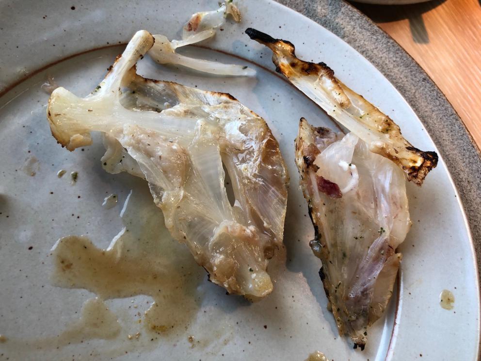 Photogallery






Noma 2.0 is in Christianshavn, the same neighbourhood as the first Noma. They’re 1.5 km apart, a 15 minutes’ walk. This picture shows the distance: to the right, there’s the warehouse of the old location (in Strandgade 93), to the left the smokestacks of Amager Bakke, the futuristic incinerator below which stands the new Noma (in Refshalevej 96)









Weather permitting, you can have a peaceful walk between the previous Noma to today’s Noma 









The new Noma is on an isthmus surrounded by canals. In the future they also want to reclaim some small parts for hydroponic farming









Bucolic scene with incinerator









Bikes left outside Noma. It’s the favourite means of transport among employees and interns









The long path taking you to the restaurant. The fence on the left shows how works are still in progress









On the two sides of the path there are the two new sections of the "Noma village", each with its specialty: grill, hot dishes, snacks, fermentations... In one month’s time, behind the fence we’ll have greenhouses, the test kitchen and the bread making area









To the left, before arriving at the restaurant, the future test kitchen. This will be run by Danish Mette Søberg with Riccardo Canella. "My first challenge?", reveals the latter, for a long time sous chef here, "is to work on the extraction of essential oils" 









The future Test Kitchen









The temporary gangway to the restaurant









Looking from the door to the restaurant, there’s a lake and the smokestacks puffing vapour from the Amager Bakke incinerator. It’s a futuristic project, both in terms of sustainability and architecture. It’s also known as Amager Slope or Copenhill, and its author is starchitect Bjarke Ingels, the same who designed the new Noma. Gradually opened in 2017, it transforms waste into electricity. The goal is to donate electricity to 62500 houses and hot water to 160000. It’s part of an ambitious project to transform Copenhagen into the first city in the world in terms of zero carbon dioxide emissions by 2025. By autumn this year, Amager Slope should open its ski slope, a climbing wall and a hiking track. You’ll be able to slalom on top of the incinerator









The windows from the dining room









Work is still in progress (photo taken on Thursday 22nd February 2018)









Traces of the old building, with barbwire. During WWII, they built bombs here









A view of the dining room at night (photo from Instagram/James Spreadbury)









The entrance to the restaurant









The usual ritual: a welcome from the entire staff, led by Rene Redzepi 









Behind the entrance, there are formaldehyde tanks with creatures from the abyss, shaped as in Damien Hirst’s works. The first image once you’re inside is to reproduce a Scandinavian village









The service kitchen is larger, more spacious and a completely open view from the dining room: "It’s the heart of our Scandinavian village", says Canella. There are 30 cooks working here now. 10 more, compared to the previous Noma









Large skylights above the cooks









There are currently more than 100 people working at Noma, of whom 63 are cooks - 26 employed, and 37 as interns









There’s fire in the kitchen, for the first time









On average, the dining room can host 40 people. "However", complains Redzepi, "there’s always someone who turns up with more people than the ones booked"









While the dining room is set, the outside space still need to be defined









The staff made the dining room decorations. There are no overly expensive designer objects









Dried fish









Seaweeds hanging from the ceiling









Dried octopus heads preserved in salt (with a balloon inside)














Bjarke Ingels and Redzepi’s plan included the wish to recreate a Danish farm









The luminous private dining room









The counter in the dining room. They drew the beams from the canals around the restaurant














The mise en place, bare and strictly without tablecloths









Water jug, candle, flower vase









A warm cloth, to begin with









Australian James Spreadbury, restaurant manager and partner at Noma









Welcome drink: Champagne extra brut Blanc d'Argile from Domaine Vouette et Sorbée









Sea Snail broth. The welcome dish at Noma is, as usual, a hot “soup”









Stefano Ferrano, from Torino, presents the following dish. There’s always a large Italian colony at Noma









Venus clams. Molluscs from Limfjord (Denmark) mixed with decorative clams, typical of Noma. Beside them, shells with blackcurrant oil and “Danish curry”, made with toasted coriander seeds, fennel and fennel seeds









The lid above the following dish. The mussels are not edible









Best of the mussel. Mussels open in a pan with water of fermented barley. «We recreate the mussel», says Canella, «using just the flaps, the best part». The paste is made with scraps from the mussel, cooked in smoked butter









The next dish is conceived and served by Riccardo Canella, the Paduan sous chef who conquered Redzepi, here with dining room intern Feline Hansen









Dried fruits and shrimps. In this case, the heads are not a decoration, but you must suck them –best not eat them because of the bones: they’re filled with a lovely prawn cream. The small crustaceans are still alive when they arrive on a ship straight from the Norwegian fjords









Inside, under the prawn broth skin, there’s fruits and vegetable preserved from the previous summer with raw prawns and gooseberry sauce with blackcurrant oil









How about beverages? There are three options, as usual: wine pairing (6 glasses plus a beer plus sake, 150 euros), juice pairing (juices and extracts, 110 euros) or a choice from the list. They recommend Champagne Chut... Libre from Val'Frison pour Dominique Derain, 50% Pinot Noir, 50% Chardonnay created by a couple who met at the old Noma. Well bodied, it will be a good match throughout the meal









As usual, the wine list starts with Champagne: the cheapest is 1400 crowns (190 euros)









White wines begin with labels from cold climates: first Austria, increasingly popular for its natural wines, then Germany, then all the others









How about Italy? Few names, among the white wines, from North and South









A dozen red/orange wines









Sea star, that is to say Cured trout roe and eggs, the emblem dish of this new era. They recommend moving the teaspoon from the heart to the edges of the tentacles. Aesthetics win over taste









Jellyfish. The jellyfish gel in the middle is in fact a clarified broth of calamari and recalls the texture of jellyfish. "We tried to cook jellyfish in 300 different ways but none was convincing so far". All around, pickled seaweed. The gel is almost tasteless, it serves to clean the palate after the pickles









Rene Redzepi himself presents the content of the first Seafood platter.









French style service with a small plate below for the empty shells









It’s made of two (per two) pieces: queen clam and mahogany clam









The Queen Clam is a very small variety of Norwegian scallop, seasoned with a vegetal reduction made with cucumber and peas miso. The red tip is the coral. "You should eat it using the top shell ", recommends Redzepi









The Mahogany clam is a centennial clam from the North Sea, very popular in Denmark and Iceland. «You can tell the age by the number of rings, like with trees», says Redzepi, «In 2007 they found one that was 450 years old. We’ve had it in the menu for a decade or so». The razor clam shell serves as teaspoon









Inside, there’s obviously not just a bare Mahogany. «We open it when the client arrives», says Canella, «remove the entrails and then slice it so as to preserve its firm texture». It’s seasoned with stir-fried gooseberry, capers of blackcurrants and blackcurrant sprouts preserved in vinegar. The sauce is made with mussel water









A note on the chairs: they’re more minimalistic. They’re no longer covered in sheepskin or leather from other Danish animals, in the style of Noma 1.0. The most significant element is the napkin: if you go to the toilet, they no longer replace it with a new one. There’s the old one, tied to the chair. "This is sustainability", they explain









The second seafood platter. It’s made of Sea cucumber and sour cream in various textures, including «chicharrones» (at 9 o’clock), sea urchins (at 12 and 3) and gigas oyster (at 6)









Sea urchins pressed in fresh cream and pumpkin seeds









Giga Oyster, a huge oyster from the Pacific, quickly steamed and garnished with pickles. Noma only reserved one thousand of these. In the menu until available









The following dish, off the menu, is again from Canella: horse mussel ragout, rare specimen of which 30 arrive at 'Noma each week









They cook the mussel as if it were kidney, in a sort of Bolognese sauce but with ginger. Ginger? "Yes, we’ve decided to include it, as with other spices, after our Mexican experience"









Another Italian presents a dish, Edoardo Fiaschi from Prato, at Noma for 3 years now









Squid in seaweed butter. An almost neglected Danish squid lightly seared in fermented koji oil, rolled and seasoned with seaweed butter and served on sticks of blackcurrant that widen its aromas. Formidable and beautiful









The following dish is inside a nice bee wax container. It’s made with balloons covered multiple times in bee wax. «We spent weeks making them. We’ve made thousands». They’re disposable...









Sea snail and roses. They recommend to: "Eat it keeping the bee wax on your hands "









Sea snail. Another small nibble from the top part of the sea snail, lightly warmed up in water and served on a reduction of lemon thyme









A sea snail toothpick, initially carved by Redzepi himself









Head of the cod, (right), the real main course at Noma









Another rather laborious recipe. «It takes half an hour just to separate the head. We remove the skin, the collagen, we cut mandibles, tongue, cheek and the part behind. We rinse it in water, spices, koji and cook it in the yakitori with a glaze of mushrooms and spiced fennel broth»









You can garnish the cod as you choose, with a paste of ants (top right corner), a slightly spicy emulsion of koji oil, water and horseradish sauce (left) and Danish curry (bottom)









On the side of the cod, there’s also wild garlic seasoned with smoked butter and roasted yeast. Intense flavour






