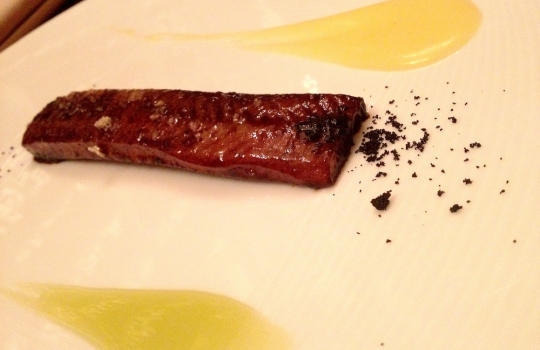 Photogallery






 
Modena’s colonnades, 186 thousand inhabitants and 3 restaurants with at least one Michelin star: Hostaria del Mare (1), Erba del Re (1) and Osteria Francescana (3 stars), our destination
 








Yellow and red tones prevail








The city still bears the signs of the May 2012 earthquake. On May 4th 2013, the day of our visit, a 3.8 magnitude earthquake was registered













By chance, Giuseppe Palmieri, maître and sommelier, appears from the grey door








Palmieri, 38, born in Matera. His first service in Francescana was on September 12th 2000








The old entrance to the restaurant, at number 24 in Via della Stella - as on the opening in 1995. It changed in September 2012: today you enter from number 22. Funnily enough, Google Maps is still set on the old entrance








The present entrance doors








Let’s start








After the latest renovations, the transit areas inside the Osteria appear as a contemporary art gallery








Mario Schifano’s world map








"Tourists", Maurizio Cattelan’s famous pigeons








Underneath the pigeons, Gavin Turk’s “Trashbag”








Three rooms, 12 tables, between 20 to 35 guests. 40% guests are Italian








Every table is illuminated by Davide Groppi’s Sampei lamp: if tables are moved, light follows








Francescana receives 150 reservations every day. But it also suffers from clients not showing up: on average, one table every week is booked but then guests don’t come








Right behind the kitchen, there’s the prêt-à-porter cellar








"In the central cellar, we only keep great vintages and larger bottles of what we consider to be great wines", Beppe Palmieri explains








1,600 wines are listed at Osteria Francescana, with a deep wine list which includes different vintages of the same wine








"A true celebration of wine "








The Ferrari coat, hanging in the cellar: Maranello is only 17 km away from Modena








Jean Todt, Michael Schumacher, Fernando Alonso: Ferrari’s “prancing horse” is at home in Via Stella








Gabrio Bini’s wines, from Pantelleria, a real fetish for Palmieri













Hanging from the ceiling, a nice selection of cured meats from Emilia








Bread made with mother yeast, the premise to a journey which will alternate great classics with very contemporary dishes








Massimo Bottura. Fifty years old last September, he is chef since 1986, the year of Trattoria del Campazzo in Nonantola. His first masters: Lidia Cristoni and Georges Cogny








He’s glowing: a few days ago his restaurant climbed, for the first time, onto the podium of the World's 50Best, a prize that is acquiring an increasing weight and authority. "The thing that makes me the happiest", he says, "is not so much the third place, but the fact that we’ve been in the highest positions for a few years now". True: 13th in 2009, 6th in 2010, 4th in 2011, 5th in 2012, 3rd in 2013








The now famous grey New Balance 993, a real emblem for the chef, friend of Jason Weis, president of the company in Massachusetts. The insole, however, is local: "In Emilia the sector is state-of-the-art", he says








"Are we ready?"








Almond granita with capers, bergamot and coffee cream 
Bottura and Palmieri’s journey across Italy starts from the bottom. And sails off from the Sicilian inland, with a classic granita which in Modena crumbles Adria-style, the wall that divides sweet from savoury, using the picklock of bitterness: Pantelleria capers, wild oregano but also bergamot, a coffee concentrate and vanilla scented salt. To pair with the first part of the meal, Sorriso di Cielo malvasia dei colli piacentini








Mediterranean Macaroon 
Next to the granita, two peculiar macaroons: the first is made with minced anchovies and sardines, the second with oysters and seaweeds. This is a classic scheme in Bottura’scuisine: his ironic turning the order of the dishes, from starter to dessert, upside down, and using popular raw materials instead of ingredients that are emblematic of élite cuisine. «While feet are sinking in the ground, the head is free to move everywhere», is one of his most famous quotes








Tempura of freshwater aulla with carpione ice-cream
Carpione ice-cream on a tempura of freshwater aulla – these fish are similar and slightly bigger than whitebait. The tempura is made by quickly placing the cold batter in boiling oil








Bread and croissants








Grissini








Baccalà Mare Nostrum 
We move up the Tyrrhenian sea to find this salted codfish cooked at low temperature and then seasoned with a touch of Naples and the Amalfi coast, that is to say with an emulsion made with hot oil with tomato vegetal liquid, olives, the zest of Sorrento’s super lemons and some anchovy colatura. These aromas crack with the scented bread on top








40 year old Denis Bretta explains the dishes as if from a book. Once at Restaurant Fini in Modena, for the past year and a half he’s been the manager responsible for the service in the restaurant. But don’t ask Palmieri to explain his role, as he’s abolished all hierarchies: "In our restaurant there are no commis or chef de rang. At a time when titles are so abused, I prefer for us to be all colleagues. All waiters."








How to burn sardines in three days 
Another journey, another horizon, the Adriatic Sea between Romagna and Ancona. A new camouflaged expression: these are not sardines (and they aren’t burnt either) but they are small sea-rock mullet, marinated for 3 days, then seared on one side on a grill, and filled like a sandwich with some (very sweet) scampi cream, and covered with vegetable ashes, aromatic herbs and lemon zest. “I wanted to make fun of the Marche-Romagna habit of grilling everything”, the chef says, “with lemon, garlic and parsley always added later to fix everything”









Rice, between fresh and sea water 
Recalling the Po estuary with freshwater and brackish sensations. The freshwater flavours cover the surface of the oyster which prevails on the river bed. And in the end, catfish, carp, vegetable chlorophyll and carpione win once again





