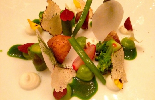 Photogallery






 
Modena’s colonnades, 186 thousand inhabitants and 3 restaurants with at least one Michelin star: Hostaria del Mare (1), Erba del Re (1) and Osteria Francescana (3 stars), our destination
 








Yellow and red tones prevail








The city still bears the signs of the May 2012 earthquake. On May 4th 2013, the day of our visit, a 3.8 magnitude earthquake was registered













By chance, Giuseppe Palmieri, maître and sommelier, appears from the grey door








Palmieri, 38, born in Matera. His first service in Francescana was on September 12th 2000








The old entrance to the restaurant, at number 24 in Via della Stella - as on the opening in 1995. It changed in September 2012: today you enter from number 22. Funnily enough, Google Maps is still set on the old entrance








The present entrance doors








Let’s start








After the latest renovations, the transit areas inside the Osteria appear as a contemporary art gallery








Mario Schifano’s world map








"Tourists", Maurizio Cattelan’s famous pigeons








Underneath the pigeons, Gavin Turk’s “Trashbag”








Three rooms, 12 tables, between 20 to 35 guests. 40% guests are Italian








Every table is illuminated by Davide Groppi’s Sampei lamp: if tables are moved, light follows








Francescana receives 150 reservations every day. But it also suffers from clients not showing up: on average, one table every week is booked but then guests don’t come








Right behind the kitchen, there’s the prêt-à-porter cellar








"In the central cellar, we only keep great vintages and larger bottles of what we consider to be great wines", Beppe Palmieri explains








1,600 wines are listed at Osteria Francescana, with a deep wine list which includes different vintages of the same wine








"A true celebration of wine "








The Ferrari coat, hanging in the cellar: Maranello is only 17 km away from Modena








Jean Todt, Michael Schumacher, Fernando Alonso: Ferrari’s “prancing horse” is at home in Via Stella








Gabrio Bini’s wines, from Pantelleria, a real fetish for Palmieri













Hanging from the ceiling, a nice selection of cured meats from Emilia








Bread made with mother yeast, the premise to a journey which will alternate great classics with very contemporary dishes








Massimo Bottura. Fifty years old last September, he is chef since 1986, the year of Trattoria del Campazzo in Nonantola. His first masters: Lidia Cristoni and Georges Cogny








He’s glowing: a few days ago his restaurant climbed, for the first time, onto the podium of the World's 50Best, a prize that is acquiring an increasing weight and authority. "The thing that makes me the happiest", he says, "is not so much the third place, but the fact that we’ve been in the highest positions for a few years now". True: 13th in 2009, 6th in 2010, 4th in 2011, 5th in 2012, 3rd in 2013








The now famous grey New Balance 993, a real emblem for the chef, friend of Jason Weis, president of the company in Massachusetts. The insole, however, is local: "In Emilia the sector is state-of-the-art", he says








"Are we ready?"








Almond granita with capers, bergamot and coffee cream 
Bottura and Palmieri’s journey across Italy starts from the bottom. And sails off from the Sicilian inland, with a classic granita which in Modena crumbles Adria-style, the wall that divides sweet from savoury, using the picklock of bitterness: Pantelleria capers, wild oregano but also bergamot, a coffee concentrate and vanilla scented salt. To pair with the first part of the meal, Sorriso di Cielo malvasia dei colli piacentini








Mediterranean Macaroon 
Next to the granita, two peculiar macaroons: the first is made with minced anchovies and sardines, the second with oysters and seaweeds. This is a classic scheme in Bottura’scuisine: his ironic turning the order of the dishes, from starter to dessert, upside down, and using popular raw materials instead of ingredients that are emblematic of élite cuisine. «While feet are sinking in the ground, the head is free to move everywhere», is one of his most famous quotes








Tempura of freshwater aulla with carpione ice-cream
Carpione ice-cream on a tempura of freshwater aulla – these fish are similar and slightly bigger than whitebait. The tempura is made by quickly placing the cold batter in boiling oil








Bread and croissants








Grissini








Baccalà Mare Nostrum 
We move up the Tyrrhenian sea to find this salted codfish cooked at low temperature and then seasoned with a touch of Naples and the Amalfi coast, that is to say with an emulsion made with hot oil with tomato vegetal liquid, olives, the zest of Sorrento’s super lemons and some anchovy colatura. These aromas crack with the scented bread on top








40 year old Denis Bretta explains the dishes as if from a book. Once at Restaurant Fini in Modena, for the past year and a half he’s been the manager responsible for the service in the restaurant. But don’t ask Palmieri to explain his role, as he’s abolished all hierarchies: "In our restaurant there are no commis or chef de rang. At a time when titles are so abused, I prefer for us to be all colleagues. All waiters."








How to burn sardines in three days 
Another journey, another horizon, the Adriatic Sea between Romagna and Ancona. A new camouflaged expression: these are not sardines (and they aren’t burnt either) but they are small sea-rock mullet, marinated for 3 days, then seared on one side on a grill, and filled like a sandwich with some (very sweet) scampi cream, and covered with vegetable ashes, aromatic herbs and lemon zest. “I wanted to make fun of the Marche-Romagna habit of grilling everything”, the chef says, “with lemon, garlic and parsley always added later to fix everything”









Rice, between fresh and sea water 
Recalling the Po estuary with freshwater and brackish sensations. The freshwater flavours cover the surface of the oyster which prevails on the river bed. And in the end, catfish, carp, vegetable chlorophyll and carpione win once again








 
A journey to Modena: Adriatic eel, polenta, Campanine apple jelly and saba
Another fluvial odyssey, presented for the first time at Identità Milano in 2011. The Adriatic eel travels across Veneto (with the polenta cream), Mantua (the Campanine apple jelly), the countryside of Modena (with the Saba lacquering, that is to say the mother of Aceto Balsamico) and stops in the centre of Modena (blackened powdered onion, a mimesis of the town’s canals)
 








Normandy
That is to say pre-salè lamb (hanging for 20 days) with an emulsion of oyster water, fresh seaweeds and caviar. On top, a green apple granita that recalls cider. “This is our tribute to Normandy”, Bretta says, “in Modena there are no enchanted beaches or breath-taking mountain tops. From Via Stella you can’t even see the Torre Ghirlandina. What guides us is the persistant strength of ideas, woven into the culture and into memories”








Giovanni Boroni’s Genziana from Trentino. A brilliant idea by Palmieri that acts as a bridge between the two dishes, Normandy (previous picture) and Think Green (next one). This distillate plays an immediate contrast with the sea-character of the first dish: "To me, harmony is what is left after a confrontation", B.P. says. And the confrontation is followed by the thought that spurs from the following match: water is added to the Genziana and the palate surprisingly longs to gulp it all. This is the perfect vehicle for the aromas of the genziana and "gives length" to the minerality of the wild herbs. "This serves to recall water, our true source of richness". Brilliant





