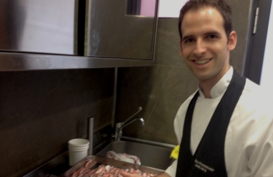 Photogallery






 
Modena’s colonnades, 186 thousand inhabitants and 3 restaurants with at least one Michelin star: Hostaria del Mare (1), Erba del Re (1) and Osteria Francescana (3 stars), our destination
 








Yellow and red tones prevail








The city still bears the signs of the May 2012 earthquake. On May 4th 2013, the day of our visit, a 3.8 magnitude earthquake was registered













By chance, Giuseppe Palmieri, maître and sommelier, appears from the grey door








Palmieri, 38, born in Matera. His first service in Francescana was on September 12th 2000








The old entrance to the restaurant, at number 24 in Via della Stella - as on the opening in 1995. It changed in September 2012: today you enter from number 22. Funnily enough, Google Maps is still set on the old entrance








The present entrance doors








Let’s start








After the latest renovations, the transit areas inside the Osteria appear as a contemporary art gallery








Mario Schifano’s world map








"Tourists", Maurizio Cattelan’s famous pigeons








Underneath the pigeons, Gavin Turk’s “Trashbag”








Three rooms, 12 tables, between 20 to 35 guests. 40% guests are Italian








Every table is illuminated by Davide Groppi’s Sampei lamp: if tables are moved, light follows








Francescana receives 150 reservations every day. But it also suffers from clients not showing up: on average, one table every week is booked but then guests don’t come








Right behind the kitchen, there’s the prêt-à-porter cellar








"In the central cellar, we only keep great vintages and larger bottles of what we consider to be great wines", Beppe Palmieri explains








1,600 wines are listed at Osteria Francescana, with a deep wine list which includes different vintages of the same wine








"A true celebration of wine "








The Ferrari coat, hanging in the cellar: Maranello is only 17 km away from Modena








Jean Todt, Michael Schumacher, Fernando Alonso: Ferrari’s “prancing horse” is at home in Via Stella








Gabrio Bini’s wines, from Pantelleria, a real fetish for Palmieri













Hanging from the ceiling, a nice selection of cured meats from Emilia








Bread made with mother yeast, the premise to a journey which will alternate great classics with very contemporary dishes








Massimo Bottura. Fifty years old last September, he is chef since 1986, the year of Trattoria del Campazzo in Nonantola. His first masters: Lidia Cristoni and Georges Cogny








He’s glowing: a few days ago his restaurant climbed, for the first time, onto the podium of the World's 50Best, a prize that is acquiring an increasing weight and authority. "The thing that makes me the happiest", he says, "is not so much the third place, but the fact that we’ve been in the highest positions for a few years now". True: 13th in 2009, 6th in 2010, 4th in 2011, 5th in 2012, 3rd in 2013








The now famous grey New Balance 993, a real emblem for the chef, friend of Jason Weis, president of the company in Massachusetts. The insole, however, is local: "In Emilia the sector is state-of-the-art", he says








"Are we ready?"








Almond granita with capers, bergamot and coffee cream 
Bottura and Palmieri’s journey across Italy starts from the bottom. And sails off from the Sicilian inland, with a classic granita which in Modena crumbles Adria-style, the wall that divides sweet from savoury, using the picklock of bitterness: Pantelleria capers, wild oregano but also bergamot, a coffee concentrate and vanilla scented salt. To pair with the first part of the meal, Sorriso di Cielo malvasia dei colli piacentini








Mediterranean Macaroon 
Next to the granita, two peculiar macaroons: the first is made with minced anchovies and sardines, the second with oysters and seaweeds. This is a classic scheme in Bottura’scuisine: his ironic turning the order of the dishes, from starter to dessert, upside down, and using popular raw materials instead of ingredients that are emblematic of élite cuisine. «While feet are sinking in the ground, the head is free to move everywhere», is one of his most famous quotes








Tempura of freshwater aulla with carpione ice-cream
Carpione ice-cream on a tempura of freshwater aulla – these fish are similar and slightly bigger than whitebait. The tempura is made by quickly placing the cold batter in boiling oil








Bread and croissants








Grissini








Baccalà Mare Nostrum 
We move up the Tyrrhenian sea to find this salted codfish cooked at low temperature and then seasoned with a touch of Naples and the Amalfi coast, that is to say with an emulsion made with hot oil with tomato vegetal liquid, olives, the zest of Sorrento’s super lemons and some anchovy colatura. These aromas crack with the scented bread on top








40 year old Denis Bretta explains the dishes as if from a book. Once at Restaurant Fini in Modena, for the past year and a half he’s been the manager responsible for the service in the restaurant. But don’t ask Palmieri to explain his role, as he’s abolished all hierarchies: "In our restaurant there are no commis or chef de rang. At a time when titles are so abused, I prefer for us to be all colleagues. All waiters."








How to burn sardines in three days 
Another journey, another horizon, the Adriatic Sea between Romagna and Ancona. A new camouflaged expression: these are not sardines (and they aren’t burnt either) but they are small sea-rock mullet, marinated for 3 days, then seared on one side on a grill, and filled like a sandwich with some (very sweet) scampi cream, and covered with vegetable ashes, aromatic herbs and lemon zest. “I wanted to make fun of the Marche-Romagna habit of grilling everything”, the chef says, “with lemon, garlic and parsley always added later to fix everything”









Rice, between fresh and sea water 
Recalling the Po estuary with freshwater and brackish sensations. The freshwater flavours cover the surface of the oyster which prevails on the river bed. And in the end, catfish, carp, vegetable chlorophyll and carpione win once again








 
A journey to Modena: Adriatic eel, polenta, Campanine apple jelly and saba
Another fluvial odyssey, presented for the first time at Identità Milano in 2011. The Adriatic eel travels across Veneto (with the polenta cream), Mantua (the Campanine apple jelly), the countryside of Modena (with the Saba lacquering, that is to say the mother of Aceto Balsamico) and stops in the centre of Modena (blackened powdered onion, a mimesis of the town’s canals)
 








Normandy
That is to say pre-salè lamb (hanging for 20 days) with an emulsion of oyster water, fresh seaweeds and caviar. On top, a green apple granita that recalls cider. “This is our tribute to Normandy”, Bretta says, “in Modena there are no enchanted beaches or breath-taking mountain tops. From Via Stella you can’t even see the Torre Ghirlandina. What guides us is the persistant strength of ideas, woven into the culture and into memories”








Giovanni Boroni’s Genziana from Trentino. A brilliant idea by Palmieri that acts as a bridge between the two dishes, Normandy (previous picture) and Think Green (next one). This distillate plays an immediate contrast with the sea-character of the first dish: "To me, harmony is what is left after a confrontation", B.P. says. And the confrontation is followed by the thought that spurs from the following match: water is added to the Genziana and the palate surprisingly longs to gulp it all. This is the perfect vehicle for the aromas of the genziana and "gives length" to the minerality of the wild herbs. "This serves to recall water, our true source of richness". Brilliant








Think Green
Vegetal chlorophyll, asparagus tops, pea cream, mushrooms, truffle, flowers, aromatic herbs and Parmigiano Reggiano curd. The idea of this dish came after observing the biological cycle of grazing cows, 4 seasons that sum up all of life. “This is what the cow eats, and what it returns to us, thanks to an extraordinary milk”, Bottura adds








Five ages of Parmigiano Reggiano 
A great classic from 1996, "when the textures in fact were 3", Palmieri points out. Today they are 5: 4 month ageing cream, 30 month demi-soufflè, 36 month mousse, 40 month crispy wafer, on top, “air” of 50 month Parmesan. (photo by Le Saucier)








A compression of pasta and beans 
Another great classic, this is a journey across Bottura’s experiences in the kitchen: Creme royal with pork rind, beans and foie gras (French tradition), rosemary air (the Spanish vanguard) and Parmesan crust (the Emilian essence) used instead of pasta. “This is a dish based on evolution, not revolution. I compressed my grandmother between Alain Ducasse and Ferran Adrià”








Snails under the grapevines 
Snails, aromatic chlorophyll on a bed of wild vegetables and herbs, with mushrooms, truffle and bulbs. After the cow’s life cycle, here comes that of the snail. "Once again, we’re chewing the territory: the best snails slither in the vineyards, among mineral, sapid and acid aromas"








A Frenchman’s dream of making pasta like an Italian 
Or, Ravioli with leeks, foie gras and truffle. We covered this in detail in Identità di Pasta issue number 27








Damijan Podversic’s Ribolla Gialla, a great wine by a wine producer from Gorizia inspired by Josko Gravner. It will support the following dish, without concealing it








A sharp knife is only served now. Another sign of the “allergy” to lengthy chewing that characterises most of contemporary high cuisine








Pigeon hunt 
And over to Bretta: "This is served in a balsamic sauce made with beetroots, which recalls blood. The salad is made with fake leaves, made by cutting out some tubers using some small stamps. These are then compressed in a vacuum with different types of vinegar. The horseradish is grated a few seconds before service, to give some velocity to the pigeon". Irony wins, since "pigeons are not hunted". The bird supplier is Franco Cazzamali from Cremona








Before the dessert, a trip to the restroom: vegetal notes prevail here too








A visit to the kitchen: capon stock








The chef watches over everything, even on the loud music wired wireless from the ceiling. When we get inside, Rod Stewart is screaming "Do you think I'm sexy?"








Meanwhile, the sauces are prepared for the evening service. There’s no break between lunch and dinner. "People sometimes leave at 5 pm because they come here to enjoy the experience of a lifetime", Palmieri reveals, "We work non-stop and every year is worse (or better, that is to say). Don’t ask me anything after midnight, though, because I can’t think straight"








Between dining room and kitchen, today 27 people work at Osteria Francescana. Many of them are interns: "Had I been offered an internship with Ducasse, at the time”, Bottura says, "I would have paid myself". In fact, he really took an internship at the Louis XV in Monte Carlo, in 1992








Leaves 
The journey takes us amidst the forests beds in Umbria: the real leaves change according to the season (black cabbage in winter, red and green basil in spring), they are caramelised and then worked with some chestnut and hazelnut paste, with a vin brulée reduction, chocolate and citrus fruits concentrate...








Magnum of Foie gras (before)
A foie gras terrine, vacuum cooked, covered with powdered toasted hazelnuts and chopped toasted almonds, finished with some apple Balsamic Vinegar. This is possibly Massimo Bottura’s most famous (and copied) dish. Alessandra Meldolesi, in her book "Sei. Autirotratto della cucina italiana d'avanguardia" she writes: "It’s a trompe-l’oeil starter in which a mould unmistakably used in the food industry, encloses the secret of the most exclusive delicacies, foie gras and Aceto Balsamico Tradizionale. This is snack versus high cuisine, dessert versus starter, entremets versus carne: the triple antiphrasis manages to get a smile"








Magnum of Foie Gras (after)
Ehm








Oops, a broken lemon tart 
A lemon tart with lemon zabaglione, lemongrass ice-cream, lemon confit, capers and bergamot (with the latter, we go back to where we had started from). This is the last dish of a masterly journey








Sous chef
Here are the staff. We start with Yoji Tokuyoshi, 35, from Japan, for 8 years at Osteria Francescana. He’s just back from the Postrivoro for Slow Fish








Managing orders
Takahiko Kondo, from Japan








Starters
Davide Di Fabio, 27 from Abruzzo








First courses
Michele Castelli, 28, Matera, in Modena since 5 years ago








Main courses
Riccardo Forapani, 27, from Cavezzo (Modena) at Osteria Francescana for the past 5 years and a half








Pastry Making
To the right, pastry-chef Alberto Buratti, 26 from Legnano (Milano), ex Antica Osteria del Ponte with Ezio Santin. With him, Matteo Conterio, from Como, 20 years old, Francescana since last month








Bread making
Bernardo Paladini, 24, from Rome, bread and pasta





