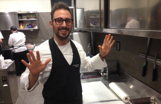 Photogallery






 
Modena’s colonnades, 186 thousand inhabitants and 3 restaurants with at least one Michelin star: Hostaria del Mare (1), Erba del Re (1) and Osteria Francescana (3 stars), our destination
 








Yellow and red tones prevail








The city still bears the signs of the May 2012 earthquake. On May 4th 2013, the day of our visit, a 3.8 magnitude earthquake was registered













By chance, Giuseppe Palmieri, maître and sommelier, appears from the grey door








Palmieri, 38, born in Matera. His first service in Francescana was on September 12th 2000








The old entrance to the restaurant, at number 24 in Via della Stella - as on the opening in 1995. It changed in September 2012: today you enter from number 22. Funnily enough, Google Maps is still set on the old entrance








The present entrance doors








Let’s start








After the latest renovations, the transit areas inside the Osteria appear as a contemporary art gallery








Mario Schifano’s world map








"Tourists", Maurizio Cattelan’s famous pigeons








Underneath the pigeons, Gavin Turk’s “Trashbag”








Three rooms, 12 tables, between 20 to 35 guests. 40% guests are Italian








Every table is illuminated by Davide Groppi’s Sampei lamp: if tables are moved, light follows








Francescana receives 150 reservations every day. But it also suffers from clients not showing up: on average, one table every week is booked but then guests don’t come








Right behind the kitchen, there’s the prêt-à-porter cellar








"In the central cellar, we only keep great vintages and larger bottles of what we consider to be great wines", Beppe Palmieri explains








1,600 wines are listed at Osteria Francescana, with a deep wine list which includes different vintages of the same wine








"A true celebration of wine "








The Ferrari coat, hanging in the cellar: Maranello is only 17 km away from Modena








Jean Todt, Michael Schumacher, Fernando Alonso: Ferrari’s “prancing horse” is at home in Via Stella








Gabrio Bini’s wines, from Pantelleria, a real fetish for Palmieri













Hanging from the ceiling, a nice selection of cured meats from Emilia








Bread made with mother yeast, the premise to a journey which will alternate great classics with very contemporary dishes








Massimo Bottura. Fifty years old last September, he is chef since 1986, the year of Trattoria del Campazzo in Nonantola. His first masters: Lidia Cristoni and Georges Cogny








He’s glowing: a few days ago his restaurant climbed, for the first time, onto the podium of the World's 50Best, a prize that is acquiring an increasing weight and authority. "The thing that makes me the happiest", he says, "is not so much the third place, but the fact that we’ve been in the highest positions for a few years now". True: 13th in 2009, 6th in 2010, 4th in 2011, 5th in 2012, 3rd in 2013








The now famous grey New Balance 993, a real emblem for the chef, friend of Jason Weis, president of the company in Massachusetts. The insole, however, is local: "In Emilia the sector is state-of-the-art", he says








"Are we ready?"








Almond granita with capers, bergamot and coffee cream 
Bottura and Palmieri’s journey across Italy starts from the bottom. And sails off from the Sicilian inland, with a classic granita which in Modena crumbles Adria-style, the wall that divides sweet from savoury, using the picklock of bitterness: Pantelleria capers, wild oregano but also bergamot, a coffee concentrate and vanilla scented salt. To pair with the first part of the meal, Sorriso di Cielo malvasia dei colli piacentini








Mediterranean Macaroon 
Next to the granita, two peculiar macaroons: the first is made with minced anchovies and sardines, the second with oysters and seaweeds. This is a classic scheme in Bottura’scuisine: his ironic turning the order of the dishes, from starter to dessert, upside down, and using popular raw materials instead of ingredients that are emblematic of élite cuisine. «While feet are sinking in the ground, the head is free to move everywhere», is one of his most famous quotes








Tempura of freshwater aulla with carpione ice-cream
Carpione ice-cream on a tempura of freshwater aulla – these fish are similar and slightly bigger than whitebait. The tempura is made by quickly placing the cold batter in boiling oil








Bread and croissants








Grissini








Baccalà Mare Nostrum 
We move up the Tyrrhenian sea to find this salted codfish cooked at low temperature and then seasoned with a touch of Naples and the Amalfi coast, that is to say with an emulsion made with hot oil with tomato vegetal liquid, olives, the zest of Sorrento’s super lemons and some anchovy colatura. These aromas crack with the scented bread on top








40 year old Denis Bretta explains the dishes as if from a book. Once at Restaurant Fini in Modena, for the past year and a half he’s been the manager responsible for the service in the restaurant. But don’t ask Palmieri to explain his role, as he’s abolished all hierarchies: "In our restaurant there are no commis or chef de rang. At a time when titles are so abused, I prefer for us to be all colleagues. All waiters."








How to burn sardines in three days 
Another journey, another horizon, the Adriatic Sea between Romagna and Ancona. A new camouflaged expression: these are not sardines (and they aren’t burnt either) but they are small sea-rock mullet, marinated for 3 days, then seared on one side on a grill, and filled like a sandwich with some (very sweet) scampi cream, and covered with vegetable ashes, aromatic herbs and lemon zest. “I wanted to make fun of the Marche-Romagna habit of grilling everything”, the chef says, “with lemon, garlic and parsley always added later to fix everything”









Rice, between fresh and sea water 
Recalling the Po estuary with freshwater and brackish sensations. The freshwater flavours cover the surface of the oyster which prevails on the river bed. And in the end, catfish, carp, vegetable chlorophyll and carpione win once again








 
A journey to Modena: Adriatic eel, polenta, Campanine apple jelly and saba
Another fluvial odyssey, presented for the first time at Identità Milano in 2011. The Adriatic eel travels across Veneto (with the polenta cream), Mantua (the Campanine apple jelly), the countryside of Modena (with the Saba lacquering, that is to say the mother of Aceto Balsamico) and stops in the centre of Modena (blackened powdered onion, a mimesis of the town’s canals)
 








Normandy
That is to say pre-salè lamb (hanging for 20 days) with an emulsion of oyster water, fresh seaweeds and caviar. On top, a green apple granita that recalls cider. “This is our tribute to Normandy”, Bretta says, “in Modena there are no enchanted beaches or breath-taking mountain tops. From Via Stella you can’t even see the Torre Ghirlandina. What guides us is the persistant strength of ideas, woven into the culture and into memories”








Giovanni Boroni’s Genziana from Trentino. A brilliant idea by Palmieri that acts as a bridge between the two dishes, Normandy (previous picture) and Think Green (next one). This distillate plays an immediate contrast with the sea-character of the first dish: "To me, harmony is what is left after a confrontation", B.P. says. And the confrontation is followed by the thought that spurs from the following match: water is added to the Genziana and the palate surprisingly longs to gulp it all. This is the perfect vehicle for the aromas of the genziana and "gives length" to the minerality of the wild herbs. "This serves to recall water, our true source of richness". Brilliant








Think Green
Vegetal chlorophyll, asparagus tops, pea cream, mushrooms, truffle, flowers, aromatic herbs and Parmigiano Reggiano curd. The idea of this dish came after observing the biological cycle of grazing cows, 4 seasons that sum up all of life. “This is what the cow eats, and what it returns to us, thanks to an extraordinary milk”, Bottura adds








Five ages of Parmigiano Reggiano 
A great classic from 1996, "when the textures in fact were 3", Palmieri points out. Today they are 5: 4 month ageing cream, 30 month demi-soufflè, 36 month mousse, 40 month crispy wafer, on top, “air” of 50 month Parmesan. (photo by Le Saucier)








A compression of pasta and beans 
Another great classic, this is a journey across Bottura’s experiences in the kitchen: Creme royal with pork rind, beans and foie gras (French tradition), rosemary air (the Spanish vanguard) and Parmesan crust (the Emilian essence) used instead of pasta. “This is a dish based on evolution, not revolution. I compressed my grandmother between Alain Ducasse and Ferran Adrià”








Snails under the grapevines 
Snails, aromatic chlorophyll on a bed of wild vegetables and herbs, with mushrooms, truffle and bulbs. After the cow’s life cycle, here comes that of the snail. "Once again, we’re chewing the territory: the best snails slither in the vineyards, among mineral, sapid and acid aromas"








A Frenchman’s dream of making pasta like an Italian 
Or, Ravioli with leeks, foie gras and truffle. We covered this in detail in Identità di Pasta issue number 27








Damijan Podversic’s Ribolla Gialla, a great wine by a wine producer from Gorizia inspired by Josko Gravner. It will support the following dish, without concealing it








A sharp knife is only served now. Another sign of the “allergy” to lengthy chewing that characterises most of contemporary high cuisine








Pigeon hunt 
And over to Bretta: "This is served in a balsamic sauce made with beetroots, which recalls blood. The salad is made with fake leaves, made by cutting out some tubers using some small stamps. These are then compressed in a vacuum with different types of vinegar. The horseradish is grated a few seconds before service, to give some velocity to the pigeon". Irony wins, since "pigeons are not hunted". The bird supplier is Franco Cazzamali from Cremona








Before the dessert, a trip to the restroom: vegetal notes prevail here too








A visit to the kitchen: capon stock








The chef watches over everything, even on the loud music wired wireless from the ceiling. When we get inside, Rod Stewart is screaming "Do you think I'm sexy?"








Meanwhile, the sauces are prepared for the evening service. There’s no break between lunch and dinner. "People sometimes leave at 5 pm because they come here to enjoy the experience of a lifetime", Palmieri reveals, "We work non-stop and every year is worse (or better, that is to say). Don’t ask me anything after midnight, though, because I can’t think straight"








Between dining room and kitchen, today 27 people work at Osteria Francescana. Many of them are interns: "Had I been offered an internship with Ducasse, at the time”, Bottura says, "I would have paid myself". In fact, he really took an internship at the Louis XV in Monte Carlo, in 1992








Leaves 
The journey takes us amidst the forests beds in Umbria: the real leaves change according to the season (black cabbage in winter, red and green basil in spring), they are caramelised and then worked with some chestnut and hazelnut paste, with a vin brulée reduction, chocolate and citrus fruits concentrate...








Magnum of Foie gras (before)
A foie gras terrine, vacuum cooked, covered with powdered toasted hazelnuts and chopped toasted almonds, finished with some apple Balsamic Vinegar. This is possibly Massimo Bottura’s most famous (and copied) dish. Alessandra Meldolesi, in her book "Sei. Autirotratto della cucina italiana d'avanguardia" she writes: "It’s a trompe-l’oeil starter in which a mould unmistakably used in the food industry, encloses the secret of the most exclusive delicacies, foie gras and Aceto Balsamico Tradizionale. This is snack versus high cuisine, dessert versus starter, entremets versus carne: the triple antiphrasis manages to get a smile"








Magnum of Foie Gras (after)
Ehm








Oops, a broken lemon tart 
A lemon tart with lemon zabaglione, lemongrass ice-cream, lemon confit, capers and bergamot (with the latter, we go back to where we had started from). This is the last dish of a masterly journey








Sous chef
Here are the staff. We start with Yoji Tokuyoshi, 35, from Japan, for 8 years at Osteria Francescana. He’s just back from the Postrivoro for Slow Fish








Managing orders
Takahiko Kondo, from Japan





