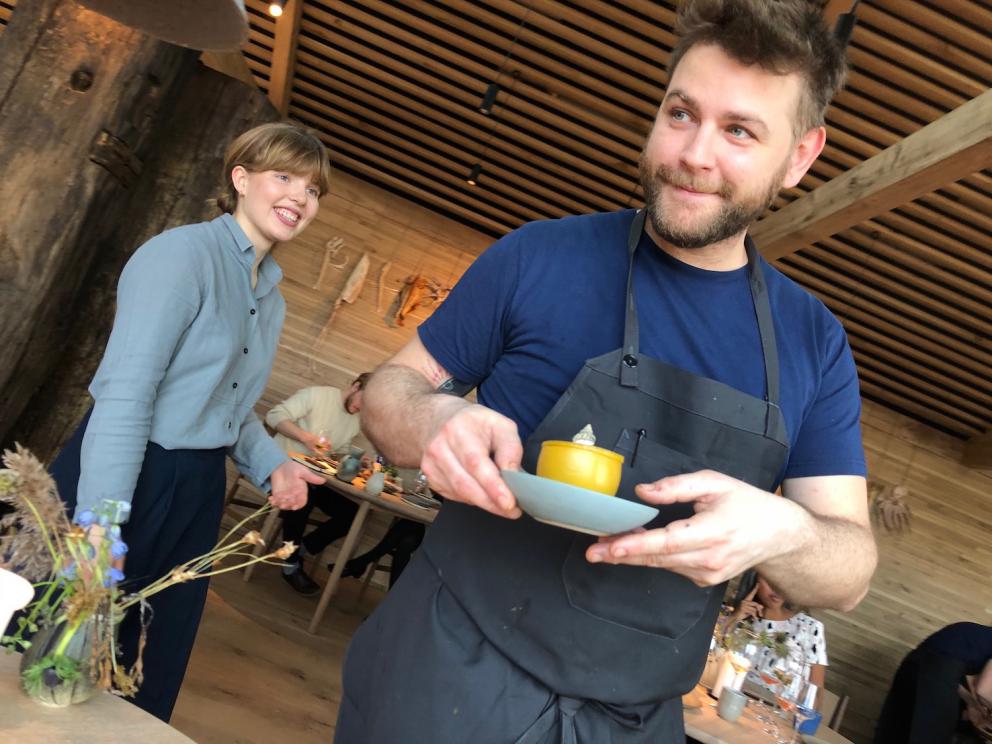 Photogallery






Noma 2.0 is in Christianshavn, the same neighbourhood as the first Noma. They’re 1.5 km apart, a 15 minutes’ walk. This picture shows the distance: to the right, there’s the warehouse of the old location (in Strandgade 93), to the left the smokestacks of Amager Bakke, the futuristic incinerator below which stands the new Noma (in Refshalevej 96)









Weather permitting, you can have a peaceful walk between the previous Noma to today’s Noma 









The new Noma is on an isthmus surrounded by canals. In the future they also want to reclaim some small parts for hydroponic farming









Bucolic scene with incinerator









Bikes left outside Noma. It’s the favourite means of transport among employees and interns









The long path taking you to the restaurant. The fence on the left shows how works are still in progress









On the two sides of the path there are the two new sections of the "Noma village", each with its specialty: grill, hot dishes, snacks, fermentations... In one month’s time, behind the fence we’ll have greenhouses, the test kitchen and the bread making area









To the left, before arriving at the restaurant, the future test kitchen. This will be run by Danish Mette Søberg with Riccardo Canella. "My first challenge?", reveals the latter, for a long time sous chef here, "is to work on the extraction of essential oils" 









The future Test Kitchen









The temporary gangway to the restaurant









Looking from the door to the restaurant, there’s a lake and the smokestacks puffing vapour from the Amager Bakke incinerator. It’s a futuristic project, both in terms of sustainability and architecture. It’s also known as Amager Slope or Copenhill, and its author is starchitect Bjarke Ingels, the same who designed the new Noma. Gradually opened in 2017, it transforms waste into electricity. The goal is to donate electricity to 62500 houses and hot water to 160000. It’s part of an ambitious project to transform Copenhagen into the first city in the world in terms of zero carbon dioxide emissions by 2025. By autumn this year, Amager Slope should open its ski slope, a climbing wall and a hiking track. You’ll be able to slalom on top of the incinerator









The windows from the dining room









Work is still in progress (photo taken on Thursday 22nd February 2018)









Traces of the old building, with barbwire. During WWII, they built bombs here









A view of the dining room at night (photo from Instagram/James Spreadbury)









The entrance to the restaurant









The usual ritual: a welcome from the entire staff, led by Rene Redzepi 









Behind the entrance, there are formaldehyde tanks with creatures from the abyss, shaped as in Damien Hirst’s works. The first image once you’re inside is to reproduce a Scandinavian village









The service kitchen is larger, more spacious and a completely open view from the dining room: "It’s the heart of our Scandinavian village", says Canella. There are 30 cooks working here now. 10 more, compared to the previous Noma









Large skylights above the cooks









There are currently more than 100 people working at Noma, of whom 63 are cooks - 26 employed, and 37 as interns









There’s fire in the kitchen, for the first time









On average, the dining room can host 40 people. "However", complains Redzepi, "there’s always someone who turns up with more people than the ones booked"









While the dining room is set, the outside space still need to be defined









The staff made the dining room decorations. There are no overly expensive designer objects









Dried fish









Seaweeds hanging from the ceiling









Dried octopus heads preserved in salt (with a balloon inside)














Bjarke Ingels and Redzepi’s plan included the wish to recreate a Danish farm









The luminous private dining room









The counter in the dining room. They drew the beams from the canals around the restaurant














The mise en place, bare and strictly without tablecloths









Water jug, candle, flower vase









A warm cloth, to begin with









Australian James Spreadbury, restaurant manager and partner at Noma









Welcome drink: Champagne extra brut Blanc d'Argile from Domaine Vouette et Sorbée









Sea Snail broth. The welcome dish at Noma is, as usual, a hot “soup”









Stefano Ferrano, from Torino, presents the following dish. There’s always a large Italian colony at Noma









Venus clams. Molluscs from Limfjord (Denmark) mixed with decorative clams, typical of Noma. Beside them, shells with blackcurrant oil and “Danish curry”, made with toasted coriander seeds, fennel and fennel seeds









The lid above the following dish. The mussels are not edible









Best of the mussel. Mussels open in a pan with water of fermented barley. «We recreate the mussel», says Canella, «using just the flaps, the best part». The paste is made with scraps from the mussel, cooked in smoked butter






