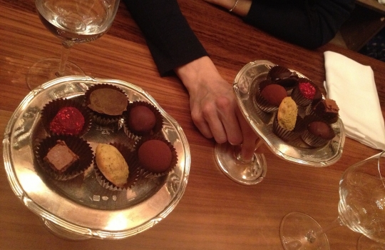 Photogallery






 
Modena’s colonnades, 186 thousand inhabitants and 3 restaurants with at least one Michelin star: Hostaria del Mare (1), Erba del Re (1) and Osteria Francescana (3 stars), our destination
 








Yellow and red tones prevail








The city still bears the signs of the May 2012 earthquake. On May 4th 2013, the day of our visit, a 3.8 magnitude earthquake was registered













By chance, Giuseppe Palmieri, maître and sommelier, appears from the grey door








Palmieri, 38, born in Matera. His first service in Francescana was on September 12th 2000








The old entrance to the restaurant, at number 24 in Via della Stella - as on the opening in 1995. It changed in September 2012: today you enter from number 22. Funnily enough, Google Maps is still set on the old entrance








The present entrance doors








Let’s start








After the latest renovations, the transit areas inside the Osteria appear as a contemporary art gallery








Mario Schifano’s world map








"Tourists", Maurizio Cattelan’s famous pigeons








Underneath the pigeons, Gavin Turk’s “Trashbag”








Three rooms, 12 tables, between 20 to 35 guests. 40% guests are Italian








Every table is illuminated by Davide Groppi’s Sampei lamp: if tables are moved, light follows








Francescana receives 150 reservations every day. But it also suffers from clients not showing up: on average, one table every week is booked but then guests don’t come








Right behind the kitchen, there’s the prêt-à-porter cellar








"In the central cellar, we only keep great vintages and larger bottles of what we consider to be great wines", Beppe Palmieri explains








1,600 wines are listed at Osteria Francescana, with a deep wine list which includes different vintages of the same wine








"A true celebration of wine "








The Ferrari coat, hanging in the cellar: Maranello is only 17 km away from Modena








Jean Todt, Michael Schumacher, Fernando Alonso: Ferrari’s “prancing horse” is at home in Via Stella








Gabrio Bini’s wines, from Pantelleria, a real fetish for Palmieri













Hanging from the ceiling, a nice selection of cured meats from Emilia








Bread made with mother yeast, the premise to a journey which will alternate great classics with very contemporary dishes








Massimo Bottura. Fifty years old last September, he is chef since 1986, the year of Trattoria del Campazzo in Nonantola. His first masters: Lidia Cristoni and Georges Cogny








He’s glowing: a few days ago his restaurant climbed, for the first time, onto the podium of the World's 50Best, a prize that is acquiring an increasing weight and authority. "The thing that makes me the happiest", he says, "is not so much the third place, but the fact that we’ve been in the highest positions for a few years now". True: 13th in 2009, 6th in 2010, 4th in 2011, 5th in 2012, 3rd in 2013








The now famous grey New Balance 993, a real emblem for the chef, friend of Jason Weis, president of the company in Massachusetts. The insole, however, is local: "In Emilia the sector is state-of-the-art", he says








"Are we ready?"








Almond granita with capers, bergamot and coffee cream 
Bottura and Palmieri’s journey across Italy starts from the bottom. And sails off from the Sicilian inland, with a classic granita which in Modena crumbles Adria-style, the wall that divides sweet from savoury, using the picklock of bitterness: Pantelleria capers, wild oregano but also bergamot, a coffee concentrate and vanilla scented salt. To pair with the first part of the meal, Sorriso di Cielo malvasia dei colli piacentini








Mediterranean Macaroon 
Next to the granita, two peculiar macaroons: the first is made with minced anchovies and sardines, the second with oysters and seaweeds. This is a classic scheme in Bottura’scuisine: his ironic turning the order of the dishes, from starter to dessert, upside down, and using popular raw materials instead of ingredients that are emblematic of élite cuisine. «While feet are sinking in the ground, the head is free to move everywhere», is one of his most famous quotes








Tempura of freshwater aulla with carpione ice-cream
Carpione ice-cream on a tempura of freshwater aulla – these fish are similar and slightly bigger than whitebait. The tempura is made by quickly placing the cold batter in boiling oil








Bread and croissants








Grissini








Baccalà Mare Nostrum 
We move up the Tyrrhenian sea to find this salted codfish cooked at low temperature and then seasoned with a touch of Naples and the Amalfi coast, that is to say with an emulsion made with hot oil with tomato vegetal liquid, olives, the zest of Sorrento’s super lemons and some anchovy colatura. These aromas crack with the scented bread on top








40 year old Denis Bretta explains the dishes as if from a book. Once at Restaurant Fini in Modena, for the past year and a half he’s been the manager responsible for the service in the restaurant. But don’t ask Palmieri to explain his role, as he’s abolished all hierarchies: "In our restaurant there are no commis or chef de rang. At a time when titles are so abused, I prefer for us to be all colleagues. All waiters."








How to burn sardines in three days 
Another journey, another horizon, the Adriatic Sea between Romagna and Ancona. A new camouflaged expression: these are not sardines (and they aren’t burnt either) but they are small sea-rock mullet, marinated for 3 days, then seared on one side on a grill, and filled like a sandwich with some (very sweet) scampi cream, and covered with vegetable ashes, aromatic herbs and lemon zest. “I wanted to make fun of the Marche-Romagna habit of grilling everything”, the chef says, “with lemon, garlic and parsley always added later to fix everything”









Rice, between fresh and sea water 
Recalling the Po estuary with freshwater and brackish sensations. The freshwater flavours cover the surface of the oyster which prevails on the river bed. And in the end, catfish, carp, vegetable chlorophyll and carpione win once again








 
A journey to Modena: Adriatic eel, polenta, Campanine apple jelly and saba
Another fluvial odyssey, presented for the first time at Identità Milano in 2011. The Adriatic eel travels across Veneto (with the polenta cream), Mantua (the Campanine apple jelly), the countryside of Modena (with the Saba lacquering, that is to say the mother of Aceto Balsamico) and stops in the centre of Modena (blackened powdered onion, a mimesis of the town’s canals)
 








Normandy
That is to say pre-salè lamb (hanging for 20 days) with an emulsion of oyster water, fresh seaweeds and caviar. On top, a green apple granita that recalls cider. “This is our tribute to Normandy”, Bretta says, “in Modena there are no enchanted beaches or breath-taking mountain tops. From Via Stella you can’t even see the Torre Ghirlandina. What guides us is the persistant strength of ideas, woven into the culture and into memories”








Giovanni Boroni’s Genziana from Trentino. A brilliant idea by Palmieri that acts as a bridge between the two dishes, Normandy (previous picture) and Think Green (next one). This distillate plays an immediate contrast with the sea-character of the first dish: "To me, harmony is what is left after a confrontation", B.P. says. And the confrontation is followed by the thought that spurs from the following match: water is added to the Genziana and the palate surprisingly longs to gulp it all. This is the perfect vehicle for the aromas of the genziana and "gives length" to the minerality of the wild herbs. "This serves to recall water, our true source of richness". Brilliant








Think Green
Vegetal chlorophyll, asparagus tops, pea cream, mushrooms, truffle, flowers, aromatic herbs and Parmigiano Reggiano curd. The idea of this dish came after observing the biological cycle of grazing cows, 4 seasons that sum up all of life. “This is what the cow eats, and what it returns to us, thanks to an extraordinary milk”, Bottura adds








Five ages of Parmigiano Reggiano 
A great classic from 1996, "when the textures in fact were 3", Palmieri points out. Today they are 5: 4 month ageing cream, 30 month demi-soufflè, 36 month mousse, 40 month crispy wafer, on top, “air” of 50 month Parmesan. (photo by Le Saucier)








A compression of pasta and beans 
Another great classic, this is a journey across Bottura’s experiences in the kitchen: Creme royal with pork rind, beans and foie gras (French tradition), rosemary air (the Spanish vanguard) and Parmesan crust (the Emilian essence) used instead of pasta. “This is a dish based on evolution, not revolution. I compressed my grandmother between Alain Ducasse and Ferran Adrià”








Snails under the grapevines 
Snails, aromatic chlorophyll on a bed of wild vegetables and herbs, with mushrooms, truffle and bulbs. After the cow’s life cycle, here comes that of the snail. "Once again, we’re chewing the territory: the best snails slither in the vineyards, among mineral, sapid and acid aromas"








A Frenchman’s dream of making pasta like an Italian 
Or, Ravioli with leeks, foie gras and truffle. We covered this in detail in Identità di Pasta issue number 27








Damijan Podversic’s Ribolla Gialla, a great wine by a wine producer from Gorizia inspired by Josko Gravner. It will support the following dish, without concealing it








A sharp knife is only served now. Another sign of the “allergy” to lengthy chewing that characterises most of contemporary high cuisine








Pigeon hunt 
And over to Bretta: "This is served in a balsamic sauce made with beetroots, which recalls blood. The salad is made with fake leaves, made by cutting out some tubers using some small stamps. These are then compressed in a vacuum with different types of vinegar. The horseradish is grated a few seconds before service, to give some velocity to the pigeon". Irony wins, since "pigeons are not hunted". The bird supplier is Franco Cazzamali from Cremona








Before the dessert, a trip to the restroom: vegetal notes prevail here too








A visit to the kitchen: capon stock








The chef watches over everything, even on the loud music wired wireless from the ceiling. When we get inside, Rod Stewart is screaming "Do you think I'm sexy?"








Meanwhile, the sauces are prepared for the evening service. There’s no break between lunch and dinner. "People sometimes leave at 5 pm because they come here to enjoy the experience of a lifetime", Palmieri reveals, "We work non-stop and every year is worse (or better, that is to say). Don’t ask me anything after midnight, though, because I can’t think straight"








Between dining room and kitchen, today 27 people work at Osteria Francescana. Many of them are interns: "Had I been offered an internship with Ducasse, at the time”, Bottura says, "I would have paid myself". In fact, he really took an internship at the Louis XV in Monte Carlo, in 1992








Leaves 
The journey takes us amidst the forests beds in Umbria: the real leaves change according to the season (black cabbage in winter, red and green basil in spring), they are caramelised and then worked with some chestnut and hazelnut paste, with a vin brulée reduction, chocolate and citrus fruits concentrate...








Magnum of Foie gras (before)
A foie gras terrine, vacuum cooked, covered with powdered toasted hazelnuts and chopped toasted almonds, finished with some apple Balsamic Vinegar. This is possibly Massimo Bottura’s most famous (and copied) dish. Alessandra Meldolesi, in her book "Sei. Autirotratto della cucina italiana d'avanguardia" she writes: "It’s a trompe-l’oeil starter in which a mould unmistakably used in the food industry, encloses the secret of the most exclusive delicacies, foie gras and Aceto Balsamico Tradizionale. This is snack versus high cuisine, dessert versus starter, entremets versus carne: the triple antiphrasis manages to get a smile"








Magnum of Foie Gras (after)
Ehm








Oops, a broken lemon tart 
A lemon tart with lemon zabaglione, lemongrass ice-cream, lemon confit, capers and bergamot (with the latter, we go back to where we had started from). This is the last dish of a masterly journey








Sous chef
Here are the staff. We start with Yoji Tokuyoshi, 35, from Japan, for 8 years at Osteria Francescana. He’s just back from the Postrivoro for Slow Fish








Managing orders
Takahiko Kondo, from Japan








Starters
Davide Di Fabio, 27 from Abruzzo








First courses
Michele Castelli, 28, Matera, in Modena since 5 years ago








Main courses
Riccardo Forapani, 27, from Cavezzo (Modena) at Osteria Francescana for the past 5 years and a half








Pastry Making
To the right, pastry-chef Alberto Buratti, 26 from Legnano (Milano), ex Antica Osteria del Ponte with Ezio Santin. With him, Matteo Conterio, from Como, 20 years old, Francescana since last month








Bread making
Bernardo Paladini, 24, from Rome, bread and pasta








Stagista
Klaus Pahl, 26, Brazilian from Sao Paolo, with a previous experience at D.O.M.








Stagista
Franco Liberali, 19, Pescara, second courses








Stagista
Lorenzo Menegatti, 19, from Torino, first courses








Antipasti
Francesco Vincenzi, 21, from Formiglia (Modena)








30 year old twins, Andrea and Luca Garelli, have been working in Francescana for 5 years (I only realised in the end that the guys where two, not one)








In sala
Monica Giordano, 31 years old, from Bologna








Pino Cesario, from Torre del Greco (Naples), arrived at Francescana two weeks ago ("Today even finding a job on the Amalfi Coast is difficult ")








Antonia Guerra, kitchen hand





