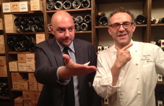 Photogallery






 
Modena’s colonnades, 186 thousand inhabitants and 3 restaurants with at least one Michelin star: Hostaria del Mare (1), Erba del Re (1) and Osteria Francescana (3 stars), our destination
 








Yellow and red tones prevail








The city still bears the signs of the May 2012 earthquake. On May 4th 2013, the day of our visit, a 3.8 magnitude earthquake was registered













By chance, Giuseppe Palmieri, maître and sommelier, appears from the grey door








Palmieri, 38, born in Matera. His first service in Francescana was on September 12th 2000








The old entrance to the restaurant, at number 24 in Via della Stella - as on the opening in 1995. It changed in September 2012: today you enter from number 22. Funnily enough, Google Maps is still set on the old entrance








The present entrance doors








Let’s start








After the latest renovations, the transit areas inside the Osteria appear as a contemporary art gallery








Mario Schifano’s world map








"Tourists", Maurizio Cattelan’s famous pigeons








Underneath the pigeons, Gavin Turk’s “Trashbag”








Three rooms, 12 tables, between 20 to 35 guests. 40% guests are Italian








Every table is illuminated by Davide Groppi’s Sampei lamp: if tables are moved, light follows








Francescana receives 150 reservations every day. But it also suffers from clients not showing up: on average, one table every week is booked but then guests don’t come








Right behind the kitchen, there’s the prêt-à-porter cellar








"In the central cellar, we only keep great vintages and larger bottles of what we consider to be great wines", Beppe Palmieri explains








1,600 wines are listed at Osteria Francescana, with a deep wine list which includes different vintages of the same wine








"A true celebration of wine "








The Ferrari coat, hanging in the cellar: Maranello is only 17 km away from Modena








Jean Todt, Michael Schumacher, Fernando Alonso: Ferrari’s “prancing horse” is at home in Via Stella








Gabrio Bini’s wines, from Pantelleria, a real fetish for Palmieri













Hanging from the ceiling, a nice selection of cured meats from Emilia








Bread made with mother yeast, the premise to a journey which will alternate great classics with very contemporary dishes








Massimo Bottura. Fifty years old last September, he is chef since 1986, the year of Trattoria del Campazzo in Nonantola. His first masters: Lidia Cristoni and Georges Cogny








He’s glowing: a few days ago his restaurant climbed, for the first time, onto the podium of the World's 50Best, a prize that is acquiring an increasing weight and authority. "The thing that makes me the happiest", he says, "is not so much the third place, but the fact that we’ve been in the highest positions for a few years now". True: 13th in 2009, 6th in 2010, 4th in 2011, 5th in 2012, 3rd in 2013








The now famous grey New Balance 993, a real emblem for the chef, friend of Jason Weis, president of the company in Massachusetts. The insole, however, is local: "In Emilia the sector is state-of-the-art", he says








"Are we ready?"








Almond granita with capers, bergamot and coffee cream 
Bottura and Palmieri’s journey across Italy starts from the bottom. And sails off from the Sicilian inland, with a classic granita which in Modena crumbles Adria-style, the wall that divides sweet from savoury, using the picklock of bitterness: Pantelleria capers, wild oregano but also bergamot, a coffee concentrate and vanilla scented salt. To pair with the first part of the meal, Sorriso di Cielo malvasia dei colli piacentini








Mediterranean Macaroon 
Next to the granita, two peculiar macaroons: the first is made with minced anchovies and sardines, the second with oysters and seaweeds. This is a classic scheme in Bottura’scuisine: his ironic turning the order of the dishes, from starter to dessert, upside down, and using popular raw materials instead of ingredients that are emblematic of élite cuisine. «While feet are sinking in the ground, the head is free to move everywhere», is one of his most famous quotes








Tempura of freshwater aulla with carpione ice-cream
Carpione ice-cream on a tempura of freshwater aulla – these fish are similar and slightly bigger than whitebait. The tempura is made by quickly placing the cold batter in boiling oil








Bread and croissants








Grissini








Baccalà Mare Nostrum 
We move up the Tyrrhenian sea to find this salted codfish cooked at low temperature and then seasoned with a touch of Naples and the Amalfi coast, that is to say with an emulsion made with hot oil with tomato vegetal liquid, olives, the zest of Sorrento’s super lemons and some anchovy colatura. These aromas crack with the scented bread on top








40 year old Denis Bretta explains the dishes as if from a book. Once at Restaurant Fini in Modena, for the past year and a half he’s been the manager responsible for the service in the restaurant. But don’t ask Palmieri to explain his role, as he’s abolished all hierarchies: "In our restaurant there are no commis or chef de rang. At a time when titles are so abused, I prefer for us to be all colleagues. All waiters."








How to burn sardines in three days 
Another journey, another horizon, the Adriatic Sea between Romagna and Ancona. A new camouflaged expression: these are not sardines (and they aren’t burnt either) but they are small sea-rock mullet, marinated for 3 days, then seared on one side on a grill, and filled like a sandwich with some (very sweet) scampi cream, and covered with vegetable ashes, aromatic herbs and lemon zest. “I wanted to make fun of the Marche-Romagna habit of grilling everything”, the chef says, “with lemon, garlic and parsley always added later to fix everything”









Rice, between fresh and sea water 
Recalling the Po estuary with freshwater and brackish sensations. The freshwater flavours cover the surface of the oyster which prevails on the river bed. And in the end, catfish, carp, vegetable chlorophyll and carpione win once again








 
A journey to Modena: Adriatic eel, polenta, Campanine apple jelly and saba
Another fluvial odyssey, presented for the first time at Identità Milano in 2011. The Adriatic eel travels across Veneto (with the polenta cream), Mantua (the Campanine apple jelly), the countryside of Modena (with the Saba lacquering, that is to say the mother of Aceto Balsamico) and stops in the centre of Modena (blackened powdered onion, a mimesis of the town’s canals)
 








Normandy
That is to say pre-salè lamb (hanging for 20 days) with an emulsion of oyster water, fresh seaweeds and caviar. On top, a green apple granita that recalls cider. “This is our tribute to Normandy”, Bretta says, “in Modena there are no enchanted beaches or breath-taking mountain tops. From Via Stella you can’t even see the Torre Ghirlandina. What guides us is the persistant strength of ideas, woven into the culture and into memories”








Giovanni Boroni’s Genziana from Trentino. A brilliant idea by Palmieri that acts as a bridge between the two dishes, Normandy (previous picture) and Think Green (next one). This distillate plays an immediate contrast with the sea-character of the first dish: "To me, harmony is what is left after a confrontation", B.P. says. And the confrontation is followed by the thought that spurs from the following match: water is added to the Genziana and the palate surprisingly longs to gulp it all. This is the perfect vehicle for the aromas of the genziana and "gives length" to the minerality of the wild herbs. "This serves to recall water, our true source of richness". Brilliant








Think Green
Vegetal chlorophyll, asparagus tops, pea cream, mushrooms, truffle, flowers, aromatic herbs and Parmigiano Reggiano curd. The idea of this dish came after observing the biological cycle of grazing cows, 4 seasons that sum up all of life. “This is what the cow eats, and what it returns to us, thanks to an extraordinary milk”, Bottura adds








Five ages of Parmigiano Reggiano 
A great classic from 1996, "when the textures in fact were 3", Palmieri points out. Today they are 5: 4 month ageing cream, 30 month demi-soufflè, 36 month mousse, 40 month crispy wafer, on top, “air” of 50 month Parmesan. (photo by Le Saucier)








A compression of pasta and beans 
Another great classic, this is a journey across Bottura’s experiences in the kitchen: Creme royal with pork rind, beans and foie gras (French tradition), rosemary air (the Spanish vanguard) and Parmesan crust (the Emilian essence) used instead of pasta. “This is a dish based on evolution, not revolution. I compressed my grandmother between Alain Ducasse and Ferran Adrià”








Snails under the grapevines 
Snails, aromatic chlorophyll on a bed of wild vegetables and herbs, with mushrooms, truffle and bulbs. After the cow’s life cycle, here comes that of the snail. "Once again, we’re chewing the territory: the best snails slither in the vineyards, among mineral, sapid and acid aromas"








A Frenchman’s dream of making pasta like an Italian 
Or, Ravioli with leeks, foie gras and truffle. We covered this in detail in Identità di Pasta issue number 27








Damijan Podversic’s Ribolla Gialla, a great wine by a wine producer from Gorizia inspired by Josko Gravner. It will support the following dish, without concealing it








A sharp knife is only served now. Another sign of the “allergy” to lengthy chewing that characterises most of contemporary high cuisine








Pigeon hunt 
And over to Bretta: "This is served in a balsamic sauce made with beetroots, which recalls blood. The salad is made with fake leaves, made by cutting out some tubers using some small stamps. These are then compressed in a vacuum with different types of vinegar. The horseradish is grated a few seconds before service, to give some velocity to the pigeon". Irony wins, since "pigeons are not hunted". The bird supplier is Franco Cazzamali from Cremona








Before the dessert, a trip to the restroom: vegetal notes prevail here too








A visit to the kitchen: capon stock








The chef watches over everything, even on the loud music wired wireless from the ceiling. When we get inside, Rod Stewart is screaming "Do you think I'm sexy?"








Meanwhile, the sauces are prepared for the evening service. There’s no break between lunch and dinner. "People sometimes leave at 5 pm because they come here to enjoy the experience of a lifetime", Palmieri reveals, "We work non-stop and every year is worse (or better, that is to say). Don’t ask me anything after midnight, though, because I can’t think straight"








Between dining room and kitchen, today 27 people work at Osteria Francescana. Many of them are interns: "Had I been offered an internship with Ducasse, at the time”, Bottura says, "I would have paid myself". In fact, he really took an internship at the Louis XV in Monte Carlo, in 1992








Leaves 
The journey takes us amidst the forests beds in Umbria: the real leaves change according to the season (black cabbage in winter, red and green basil in spring), they are caramelised and then worked with some chestnut and hazelnut paste, with a vin brulée reduction, chocolate and citrus fruits concentrate...








Magnum of Foie gras (before)
A foie gras terrine, vacuum cooked, covered with powdered toasted hazelnuts and chopped toasted almonds, finished with some apple Balsamic Vinegar. This is possibly Massimo Bottura’s most famous (and copied) dish. Alessandra Meldolesi, in her book "Sei. Autirotratto della cucina italiana d'avanguardia" she writes: "It’s a trompe-l’oeil starter in which a mould unmistakably used in the food industry, encloses the secret of the most exclusive delicacies, foie gras and Aceto Balsamico Tradizionale. This is snack versus high cuisine, dessert versus starter, entremets versus carne: the triple antiphrasis manages to get a smile"








Magnum of Foie Gras (after)
Ehm








Oops, a broken lemon tart 
A lemon tart with lemon zabaglione, lemongrass ice-cream, lemon confit, capers and bergamot (with the latter, we go back to where we had started from). This is the last dish of a masterly journey








Sous chef
Here are the staff. We start with Yoji Tokuyoshi, 35, from Japan, for 8 years at Osteria Francescana. He’s just back from the Postrivoro for Slow Fish








Managing orders
Takahiko Kondo, from Japan








Starters
Davide Di Fabio, 27 from Abruzzo








First courses
Michele Castelli, 28, Matera, in Modena since 5 years ago








Main courses
Riccardo Forapani, 27, from Cavezzo (Modena) at Osteria Francescana for the past 5 years and a half








Pastry Making
To the right, pastry-chef Alberto Buratti, 26 from Legnano (Milano), ex Antica Osteria del Ponte with Ezio Santin. With him, Matteo Conterio, from Como, 20 years old, Francescana since last month








Bread making
Bernardo Paladini, 24, from Rome, bread and pasta








Stagista
Klaus Pahl, 26, Brazilian from Sao Paolo, with a previous experience at D.O.M.








Stagista
Franco Liberali, 19, Pescara, second courses








Stagista
Lorenzo Menegatti, 19, from Torino, first courses








Antipasti
Francesco Vincenzi, 21, from Formiglia (Modena)








30 year old twins, Andrea and Luca Garelli, have been working in Francescana for 5 years (I only realised in the end that the guys where two, not one)








In sala
Monica Giordano, 31 years old, from Bologna








Pino Cesario, from Torre del Greco (Naples), arrived at Francescana two weeks ago ("Today even finding a job on the Amalfi Coast is difficult ")








Antonia Guerra, kitchen hand








Back to the table for the petits fours








And a great coffee signed by Leonardo Lelli








Average prices: starters 45, first courses 45, main courses 60, desserts 25 euros. 
Tasting menu: 110 euros (Traditions), 150 euros (Classics), 180 euros (Sensations, seasonal plates from the experimental kitchen).
 The complete menu in pdf








Before returning to see the stars...








...ask Palmieri, aka GlocalOnTour, for his advice: on his blog, there’s a detailed – food and non-food – map of what’s best in Modena





