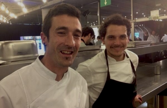 Photogallery






With 250thousand inhabitants, Gent (or Gand) is the third largest city in Belgium. With its canals and its laid back life, it competes with Bruges for the title most beautiful city in the Flanders 








The Sunday began at the Flemish Food Fest, a festival in which everyone was grilling all sorts of food. In the photo, the chef table with many of the chefs that were to be the protagonists of the Gelinaz! dinner








Colagreco, Redzepi and the kitchen-van. The location was kept secret until the beginning of the show, at around 7 pm








The two long tables set at the Icc in Gent. Three shifts: 1-8, 9-16, 17-24. We were so lucky we enjoyed them all








In the kitchen, works to dismember the chickens from Gent begin








"Even I don’t know what will happen tonight. And please remember: this is a performance, not a dinner", says Andrea Petrini, founder and curator of the event named after chef Fulvio Pieran-gelinaz and by Gorillaz, the temporary band that Blur’s Damon Albarn creates whenever he feels like it. The black sculpture underneath the Madonna is that of    Philippe Édouard Cauderlier (Antwerp, 1812-1887)








It all starts by quoting Kubrick and Eyes Wide Shot... Each dish is a song. And each of the three acts is separated by various artistic performances. In the dining room, men act as nothing is going on in front of their partners








First dish of the Gelinaz evening, Philippe Edouard Cauderlier’s Cold-hot chicken timbale, the original recipe from     1861. Roger Souvereyns of Scholteshof in Stevoort had the honour of performing it at the Icc in Gent








Inaki Aizpitarte     ’s Royal chicken kir, using all the ingredients in the original recipe. The wine is diluted in the chicken stock. The dish arrives together with     Wu Tang Clan’s rap








Anataoly Komm of Varvary in Moscow, lets us taste his Maki Roll behind the scenes








Komm’s Maki roll: chicken and vegetables wrapped in a turnip leaf. The sauce is made with walnuts, a Caucasian tradition








Agata Felluga ’s Lotus timbale. She’s the Italian sous chef at Chateaubriand in Paris, with a previous experience at Pascal Barbot’sAstrance. The dish is inspired by a Japanese sticky rice recipe, where the rice is cooked in a lotus leaf. Here, instead, there’s    Cauderlier’s chicken, together with miso, tamarind syrup, pork fat, soy sauce. A very complex dish.








Left, 32 year old Agata Felluga, born in Rome and adopted by the Ville Lumiére








Petter Nilsson’s Bread chicken, from the Gazzetta in Paris. It is made with all the cereals hens eat during their life: corn, hulled wheat, barley, rye and wheat. The photo of the bag is a portrait of the Danish chef’s creation








Massimo Bottura     is not in Gent, however, in a coup de theatre, his brother Paolo takes his place, here on the left with Alberto Buratti,     pastry-chef at Osteria Francescana. The chef from Modena explains in a video the reason behind his absence: "In Modena, his team is so finely     tuned that even my car-salesman brother can take my place", he jokes








Even in Bottura’s dish there’s no traditional chicken: it’s called Chicken, chicken, where are you? It is the re-interpretation     of the classic chicken salad, with a stock made with roasted chicken below, and a cotechino (cooked pork sausage) and agar-agar gelatine with very small dices of peas, carrots, potatoes, red and yellow peppers, onions, tomatoes... in the background, "What about the noise?" by    John Cage strikes us








Pea tendrils with chicken and mint aspic     by Blaine Wetzel, once a pupil of Redzepi, today back home in Lummi Island, a paradise in the middle of nowhere, in     Washington state. The tendrils are grilled. A great dish, with a super balance between smoke, balsamic and acid notes








Chia and chicken with tiger milk, turnips and coca leaves , that is to say "The chicken of Gent meets South America", a journey of the mind, from the Pacific ocean to the Andes to the Amazon forest led by Peruvian    Virgilio Martinez








Virgilio Martinez     at work with Alberto Buratti








Chicken liver, scallion with tarragon, turnip and toasted cauliflower stock by Basque Josean Alija








French-Spanish journalist Maria Canabal and Josean Martinez Alija








Poulet-mayo by Bertrand Grébaut of   Septime in Paris, a cold entrée with all the ingredients of the original recipe. In the background, Rufus Thomas ’s r 'n' b with "Do the funky chicken"








Reneè Redzepi has no doubt when it comes to which is the best part of the chicken: the skin. Half of the guest, as it turned out, agreed with him








Redzepi, on the left, explains his passion for chicken, discovered when he was a child in Macedonia. "I had to prepare this dish at home because it is fucking complicated"








Here it is: it’s not exactly chicken skin, but the “skin” made with a stock prepared using all the ingredients in Cauderlier’s recipe, removing the froth. A single, fantastic morsel, one of the many intervals that compose the first part of a dinner at Noma








We peek into the iPad of Italian Emilia Terragni who works for Phaidon in London, and is sitting at the table next to     ours, and we see a juicy preview: the triple format of Renè Redzepi’s next book, which will be out in November. It’s a sort of diary, an     intimate one, too, in which he explains how difficult dealing with the limelight is








The monumental “skyscrapers” of Six degrees of separations, Davide Scabin’s fantastic idea








In Scabin’s dish, there are 6 of the ingredients in the original recipe, but cooked separately, 6 "morsels" composed by: 1. Porto gelatine with carrot, pea and pea gelatine 2. Chicken mousse filled with livers and two pop corns to keep them firm 3. A pork jelly with tarragon vinegar 4. Cucumber roll with French beans and soy sauce jelly 5. Pork feet and tongue gelatine. And the 6th? Sorry, no response. On the left we find a light chicken royale served in a Martini glass








The Combal.Zero Trio, from Rivoli. In the background, the chosen music was Frank Zappa’s dystonic Bolero








Not a chicken     , in fact it is an oyster with a spicy tabbouleh with pork feet. An extraordinary dish by Daniel Patterson of Coi in San     Francisco. In the background, "Cool Thing", progressive rock by Sonic Youth








Chicken tea by Eneko Atxa. Cooked in infusion in the coffee machine, it includes chicken cut into pieces, carrots, onions, cauliflowers, French beans, baby carrots and edible flowers such as verbena





