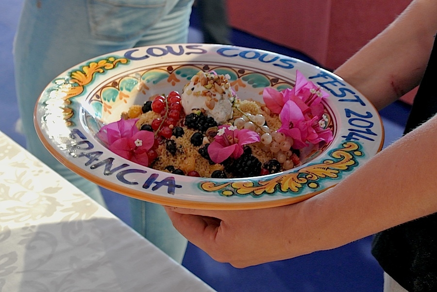 Galleria fotograficaIl cannolo di cous cous di Enrico Panero, del ristorante Da Vinci a Eataly Firenze, usato come evidenziatorePrima nazione in gara al Cous Cous Fest 2014 il Marocco con Majda Nabaoui, cuoca 19enne in forza all'Osteria Francescana a ModenaMajda Nabaoui, in Italia, a Modena, dall'et&agrave; di 9 anni, ha chiamato la sua proposta Da Modena al Marocco passando per la Sicilia, la sua colazione la mattina di sabatoI due concorrenti della Tunisia, entrambi in forza al Taglio a Milano, a destra Domenico della Salandra e al centro Mohamed Mabrouk catturato dalla bellezza della presentatrice Eliana ChiavettaL'Arancino di cous cous grazie al quale la Tunisia &egrave; arrivata alla finale a livello di giuria popolare superando il Marocco per appena un centesimo: 8,92 contro 8,91. Al suo interno scampi freschi. Nota curiosa: visto che eravano nel Trapanese, quindi Sicilia occidentale, sarebbe stato pi&ugrave; corretto chiamare il piatto ArancinaTre giorni di assaggi, tutto nel PalaBia, il tendone ridosso della spiaggia di San Vito Lo Capo. Il cielo ti invitava a mollare tutto e a tuffarti