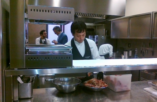 Photogallery






 
Modena’s colonnades, 186 thousand inhabitants and 3 restaurants with at least one Michelin star: Hostaria del Mare (1), Erba del Re (1) and Osteria Francescana (3 stars), our destination
 








Yellow and red tones prevail








The city still bears the signs of the May 2012 earthquake. On May 4th 2013, the day of our visit, a 3.8 magnitude earthquake was registered













By chance, Giuseppe Palmieri, maître and sommelier, appears from the grey door








Palmieri, 38, born in Matera. His first service in Francescana was on September 12th 2000








The old entrance to the restaurant, at number 24 in Via della Stella - as on the opening in 1995. It changed in September 2012: today you enter from number 22. Funnily enough, Google Maps is still set on the old entrance








The present entrance doors








Let’s start








After the latest renovations, the transit areas inside the Osteria appear as a contemporary art gallery








Mario Schifano’s world map








"Tourists", Maurizio Cattelan’s famous pigeons








Underneath the pigeons, Gavin Turk’s “Trashbag”








Three rooms, 12 tables, between 20 to 35 guests. 40% guests are Italian








Every table is illuminated by Davide Groppi’s Sampei lamp: if tables are moved, light follows








Francescana receives 150 reservations every day. But it also suffers from clients not showing up: on average, one table every week is booked but then guests don’t come








Right behind the kitchen, there’s the prêt-à-porter cellar








"In the central cellar, we only keep great vintages and larger bottles of what we consider to be great wines", Beppe Palmieri explains








1,600 wines are listed at Osteria Francescana, with a deep wine list which includes different vintages of the same wine








"A true celebration of wine "








The Ferrari coat, hanging in the cellar: Maranello is only 17 km away from Modena








Jean Todt, Michael Schumacher, Fernando Alonso: Ferrari’s “prancing horse” is at home in Via Stella








Gabrio Bini’s wines, from Pantelleria, a real fetish for Palmieri













Hanging from the ceiling, a nice selection of cured meats from Emilia








Bread made with mother yeast, the premise to a journey which will alternate great classics with very contemporary dishes








Massimo Bottura. Fifty years old last September, he is chef since 1986, the year of Trattoria del Campazzo in Nonantola. His first masters: Lidia Cristoni and Georges Cogny








He’s glowing: a few days ago his restaurant climbed, for the first time, onto the podium of the World's 50Best, a prize that is acquiring an increasing weight and authority. "The thing that makes me the happiest", he says, "is not so much the third place, but the fact that we’ve been in the highest positions for a few years now". True: 13th in 2009, 6th in 2010, 4th in 2011, 5th in 2012, 3rd in 2013








The now famous grey New Balance 993, a real emblem for the chef, friend of Jason Weis, president of the company in Massachusetts. The insole, however, is local: "In Emilia the sector is state-of-the-art", he says








"Are we ready?"








Almond granita with capers, bergamot and coffee cream 
Bottura and Palmieri’s journey across Italy starts from the bottom. And sails off from the Sicilian inland, with a classic granita which in Modena crumbles Adria-style, the wall that divides sweet from savoury, using the picklock of bitterness: Pantelleria capers, wild oregano but also bergamot, a coffee concentrate and vanilla scented salt. To pair with the first part of the meal, Sorriso di Cielo malvasia dei colli piacentini








Mediterranean Macaroon 
Next to the granita, two peculiar macaroons: the first is made with minced anchovies and sardines, the second with oysters and seaweeds. This is a classic scheme in Bottura’scuisine: his ironic turning the order of the dishes, from starter to dessert, upside down, and using popular raw materials instead of ingredients that are emblematic of élite cuisine. «While feet are sinking in the ground, the head is free to move everywhere», is one of his most famous quotes








Tempura of freshwater aulla with carpione ice-cream
Carpione ice-cream on a tempura of freshwater aulla – these fish are similar and slightly bigger than whitebait. The tempura is made by quickly placing the cold batter in boiling oil








Bread and croissants








Grissini








Baccalà Mare Nostrum 
We move up the Tyrrhenian sea to find this salted codfish cooked at low temperature and then seasoned with a touch of Naples and the Amalfi coast, that is to say with an emulsion made with hot oil with tomato vegetal liquid, olives, the zest of Sorrento’s super lemons and some anchovy colatura. These aromas crack with the scented bread on top








40 year old Denis Bretta explains the dishes as if from a book. Once at Restaurant Fini in Modena, for the past year and a half he’s been the manager responsible for the service in the restaurant. But don’t ask Palmieri to explain his role, as he’s abolished all hierarchies: "In our restaurant there are no commis or chef de rang. At a time when titles are so abused, I prefer for us to be all colleagues. All waiters."








How to burn sardines in three days 
Another journey, another horizon, the Adriatic Sea between Romagna and Ancona. A new camouflaged expression: these are not sardines (and they aren’t burnt either) but they are small sea-rock mullet, marinated for 3 days, then seared on one side on a grill, and filled like a sandwich with some (very sweet) scampi cream, and covered with vegetable ashes, aromatic herbs and lemon zest. “I wanted to make fun of the Marche-Romagna habit of grilling everything”, the chef says, “with lemon, garlic and parsley always added later to fix everything”









Rice, between fresh and sea water 
Recalling the Po estuary with freshwater and brackish sensations. The freshwater flavours cover the surface of the oyster which prevails on the river bed. And in the end, catfish, carp, vegetable chlorophyll and carpione win once again








 
A journey to Modena: Adriatic eel, polenta, Campanine apple jelly and saba
Another fluvial odyssey, presented for the first time at Identità Milano in 2011. The Adriatic eel travels across Veneto (with the polenta cream), Mantua (the Campanine apple jelly), the countryside of Modena (with the Saba lacquering, that is to say the mother of Aceto Balsamico) and stops in the centre of Modena (blackened powdered onion, a mimesis of the town’s canals)
 








Normandy
That is to say pre-salè lamb (hanging for 20 days) with an emulsion of oyster water, fresh seaweeds and caviar. On top, a green apple granita that recalls cider. “This is our tribute to Normandy”, Bretta says, “in Modena there are no enchanted beaches or breath-taking mountain tops. From Via Stella you can’t even see the Torre Ghirlandina. What guides us is the persistant strength of ideas, woven into the culture and into memories”








Giovanni Boroni’s Genziana from Trentino. A brilliant idea by Palmieri that acts as a bridge between the two dishes, Normandy (previous picture) and Think Green (next one). This distillate plays an immediate contrast with the sea-character of the first dish: "To me, harmony is what is left after a confrontation", B.P. says. And the confrontation is followed by the thought that spurs from the following match: water is added to the Genziana and the palate surprisingly longs to gulp it all. This is the perfect vehicle for the aromas of the genziana and "gives length" to the minerality of the wild herbs. "This serves to recall water, our true source of richness". Brilliant








Think Green
Vegetal chlorophyll, asparagus tops, pea cream, mushrooms, truffle, flowers, aromatic herbs and Parmigiano Reggiano curd. The idea of this dish came after observing the biological cycle of grazing cows, 4 seasons that sum up all of life. “This is what the cow eats, and what it returns to us, thanks to an extraordinary milk”, Bottura adds








Five ages of Parmigiano Reggiano 
A great classic from 1996, "when the textures in fact were 3", Palmieri points out. Today they are 5: 4 month ageing cream, 30 month demi-soufflè, 36 month mousse, 40 month crispy wafer, on top, “air” of 50 month Parmesan. (photo by Le Saucier)








A compression of pasta and beans 
Another great classic, this is a journey across Bottura’s experiences in the kitchen: Creme royal with pork rind, beans and foie gras (French tradition), rosemary air (the Spanish vanguard) and Parmesan crust (the Emilian essence) used instead of pasta. “This is a dish based on evolution, not revolution. I compressed my grandmother between Alain Ducasse and Ferran Adrià”








Snails under the grapevines 
Snails, aromatic chlorophyll on a bed of wild vegetables and herbs, with mushrooms, truffle and bulbs. After the cow’s life cycle, here comes that of the snail. "Once again, we’re chewing the territory: the best snails slither in the vineyards, among mineral, sapid and acid aromas"








A Frenchman’s dream of making pasta like an Italian 
Or, Ravioli with leeks, foie gras and truffle. We covered this in detail in Identità di Pasta issue number 27








Damijan Podversic’s Ribolla Gialla, a great wine by a wine producer from Gorizia inspired by Josko Gravner. It will support the following dish, without concealing it








A sharp knife is only served now. Another sign of the “allergy” to lengthy chewing that characterises most of contemporary high cuisine








Pigeon hunt 
And over to Bretta: "This is served in a balsamic sauce made with beetroots, which recalls blood. The salad is made with fake leaves, made by cutting out some tubers using some small stamps. These are then compressed in a vacuum with different types of vinegar. The horseradish is grated a few seconds before service, to give some velocity to the pigeon". Irony wins, since "pigeons are not hunted". The bird supplier is Franco Cazzamali from Cremona








Before the dessert, a trip to the restroom: vegetal notes prevail here too








A visit to the kitchen: capon stock








The chef watches over everything, even on the loud music wired wireless from the ceiling. When we get inside, Rod Stewart is screaming "Do you think I'm sexy?"








Meanwhile, the sauces are prepared for the evening service. There’s no break between lunch and dinner. "People sometimes leave at 5 pm because they come here to enjoy the experience of a lifetime", Palmieri reveals, "We work non-stop and every year is worse (or better, that is to say). Don’t ask me anything after midnight, though, because I can’t think straight"








Between dining room and kitchen, today 27 people work at Osteria Francescana. Many of them are interns: "Had I been offered an internship with Ducasse, at the time”, Bottura says, "I would have paid myself". In fact, he really took an internship at the Louis XV in Monte Carlo, in 1992








Leaves 
The journey takes us amidst the forests beds in Umbria: the real leaves change according to the season (black cabbage in winter, red and green basil in spring), they are caramelised and then worked with some chestnut and hazelnut paste, with a vin brulée reduction, chocolate and citrus fruits concentrate...








Magnum of Foie gras (before)
A foie gras terrine, vacuum cooked, covered with powdered toasted hazelnuts and chopped toasted almonds, finished with some apple Balsamic Vinegar. This is possibly Massimo Bottura’s most famous (and copied) dish. Alessandra Meldolesi, in her book "Sei. Autirotratto della cucina italiana d'avanguardia" she writes: "It’s a trompe-l’oeil starter in which a mould unmistakably used in the food industry, encloses the secret of the most exclusive delicacies, foie gras and Aceto Balsamico Tradizionale. This is snack versus high cuisine, dessert versus starter, entremets versus carne: the triple antiphrasis manages to get a smile"








Magnum of Foie Gras (after)
Ehm








Oops, a broken lemon tart 
A lemon tart with lemon zabaglione, lemongrass ice-cream, lemon confit, capers and bergamot (with the latter, we go back to where we had started from). This is the last dish of a masterly journey





