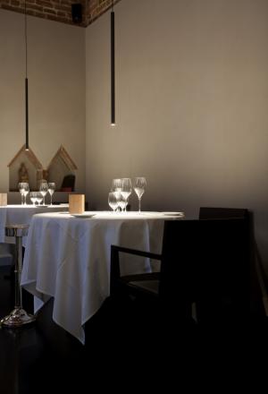 Photogallery






Le Calandre, Rubano (Padova)
It’s one of our first high cuisine projects. Massimo and Raffaele Alajmo agreed right from the start with the idea of using light in the dish. We wanted an object that would characterise them, so we created the Ovo lamp, because eggs, according to the chef from Padua, are an essential ingredient in contemporary cuisine. There’s one Ovo projecting a direct light on the plate, and one Ovo that re-interprets the old suspension lamps used in inns. Light, in this case, contributes in creating a greater intimacy among the guests








Osteria Francescana, Modena
In the project with which Massimo Bottura revolutionised his restaurant, last summer, he wanted to obtain a flexible lighting system for the two rooms in his restaurant. Given the wide spaces between one table and the other, we decided to use the Sampei lamp: if we move the tables, the light will follow them. They are like grass, thin and very tall fishing rods - recalling a vision of Japan – on top of which a spotlight was placed, generating a particular emotional tension. We have greatly worked at valorising the corridor that leads to the two rooms: each artwork is illuminated with Nulla, holes in the ceiling from which very powerful beams of light come out





