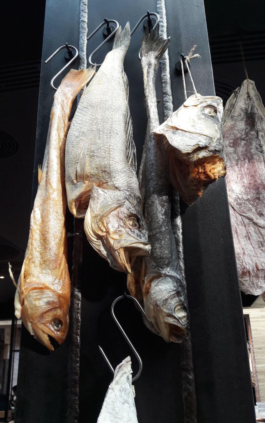 Photogallery






Noma 2.0 is in Christianshavn, the same neighbourhood as the first Noma. They’re 1.5 km apart, a 15 minutes’ walk. This picture shows the distance: to the right, there’s the warehouse of the old location (in Strandgade 93), to the left the smokestacks of Amager Bakke, the futuristic incinerator below which stands the new Noma (in Refshalevej 96)









Weather permitting, you can have a peaceful walk between the previous Noma to today’s Noma 









The new Noma is on an isthmus surrounded by canals. In the future they also want to reclaim some small parts for hydroponic farming









Bucolic scene with incinerator









Bikes left outside Noma. It’s the favourite means of transport among employees and interns









The long path taking you to the restaurant. The fence on the left shows how works are still in progress









On the two sides of the path there are the two new sections of the "Noma village", each with its specialty: grill, hot dishes, snacks, fermentations... In one month’s time, behind the fence we’ll have greenhouses, the test kitchen and the bread making area









To the left, before arriving at the restaurant, the future test kitchen. This will be run by Danish Mette Søberg with Riccardo Canella. "My first challenge?", reveals the latter, for a long time sous chef here, "is to work on the extraction of essential oils" 









The future Test Kitchen









The temporary gangway to the restaurant









Looking from the door to the restaurant, there’s a lake and the smokestacks puffing vapour from the Amager Bakke incinerator. It’s a futuristic project, both in terms of sustainability and architecture. It’s also known as Amager Slope or Copenhill, and its author is starchitect Bjarke Ingels, the same who designed the new Noma. Gradually opened in 2017, it transforms waste into electricity. The goal is to donate electricity to 62500 houses and hot water to 160000. It’s part of an ambitious project to transform Copenhagen into the first city in the world in terms of zero carbon dioxide emissions by 2025. By autumn this year, Amager Slope should open its ski slope, a climbing wall and a hiking track. You’ll be able to slalom on top of the incinerator









The windows from the dining room









Work is still in progress (photo taken on Thursday 22nd February 2018)









Traces of the old building, with barbwire. During WWII, they built bombs here









A view of the dining room at night (photo from Instagram/James Spreadbury)









The entrance to the restaurant









The usual ritual: a welcome from the entire staff, led by Rene Redzepi 









Behind the entrance, there are formaldehyde tanks with creatures from the abyss, shaped as in Damien Hirst’s works. The first image once you’re inside is to reproduce a Scandinavian village









The service kitchen is larger, more spacious and a completely open view from the dining room: "It’s the heart of our Scandinavian village", says Canella. There are 30 cooks working here now. 10 more, compared to the previous Noma









Large skylights above the cooks









There are currently more than 100 people working at Noma, of whom 63 are cooks - 26 employed, and 37 as interns









There’s fire in the kitchen, for the first time









On average, the dining room can host 40 people. "However", complains Redzepi, "there’s always someone who turns up with more people than the ones booked"









While the dining room is set, the outside space still need to be defined









The staff made the dining room decorations. There are no overly expensive designer objects






