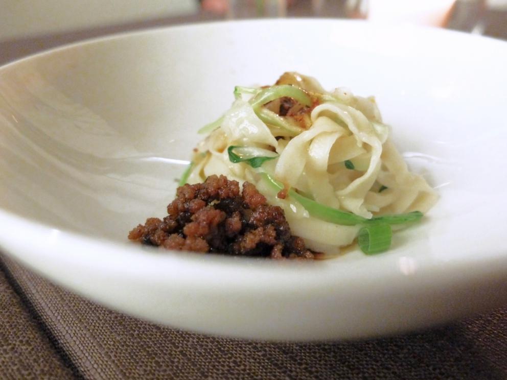 Galleria fotograficaNido di patate e uovo di quaglia al vapore, con riduzione di curry, latte di cocco e acqua di pomodoro
Raviolo in coppia cottura (effetto cruncy alla base) con lonza, frittata di uova ed&nbsp;erba cipollina cinese jiu cai (Allium tuberosum)
Garza di farina croccante, crema di avocado, mango, anatra, polvere di passion fruit, cannella, anice stellato e peperoncino
Raviolo di pasta di zucca e grano duro con shiitake, tofu affumicato, bamb&ugrave; essiccato, sesamo e carote
Il raviolo di gamberi &egrave; un classico della cucina cinese, &laquo;spesso &egrave; di produzione industriale, cos&igrave; noi per distinguerci intanto gli cambiamo la forma e poi lo realizziamo con una doppia sfoglia che deve quindi essere sottilissima&raquo;, fatta con amido di frumento. Il ripieno &egrave; di gamberi, acqua di zenzero e cipollotto. Sullo sfondo, il raviolo tondo &egrave; il Bung fritto di anatra disidratata con pepe di Sichuan e zenzero
La parte croccante &egrave; ottenuta dalla reazione tra amido e purea di patate cinesi, col burro; sopra una crema di mela aromatizzata al limone per dare acidit&agrave;, il ripieno &egrave; di funghi champignons tritati e rosolati con alloro, vino di riso e scalogno
Tris: in primo piano il Cannellone con gambero impanato; dietro uno Shao Mai con capesante,&nbsp;gamberi e wasabi; in fondo uno&nbsp;Shao Long Bao in brodo di granchio e carne
Capesante, foglie di spinacino, mango del Vietnam, pera cinese cotta con limone e miele e condita con salsa di soia, limone e olio extravergine, poi c'&egrave; il pane cinese cotto al vapore, passato alla salamandra e tagliato con l'affettatrice, per dare una nota croccante
Uovo infuso nel t&egrave;, piatto davvero complesso e tecnico: l'uovo sodo viene infuso per due ore in un liquido aromatizzato con t&egrave; verde, soia, alloro, vino di riso e anice stellato, poi affumicato bruciando (ma togliendo l'aria) riso, zucchero e foglie di t&egrave; verde, quindi racchiuso in foglie morbide di pak choi e accompagnato con un'aria dello stesso infuso. &laquo;A Pechino cuociono l'uovo in questa soluzione anche per due giorni, noi no perch&eacute; risulterebbe troppo asciutto&raquo;
Cetriolo karela, funghi shiitake, carne di maiale, gamberi, peperoncino: morbido-croccante-cremoso-dolce-grasso-piccante-umami
Riso basmati, uovo, carne di maiale, gambero essiccato, cipollotto, pak choi, brodi di salsa di ostrica e di maiale: l'uovo sbattuto viene filtrato in acqua e poi cotto al vapore, prende una consistenza quasi gelatinosa &laquo;ma alzando la fiamma si formano anche le bollicine al suo interno&raquo;
Riso con ombrina essiccata. &laquo;Voi usate molto i sottoli e i sottaceti, noi in Cina di pi&ugrave; l'essicazione, il sotto sale e le fermentazioni. A volte danno risultati che risultano poco comprensibili per il&nbsp;palato occidentale&raquo;. In questo caso l'esito &egrave; invece superbo: il riso viene cotto nel fumetto di ombrina, poi il suo filetto a guarnire
