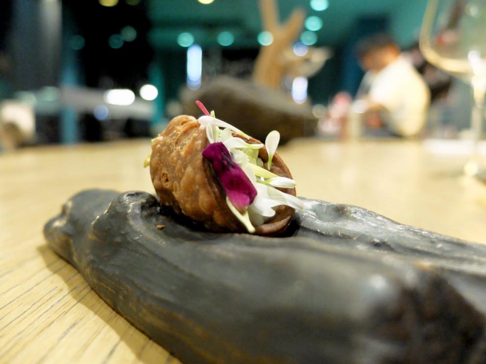 PhotogalleryThe tasting at Tokuyoshi&rsquo;s begins with Lacrime di verdura, mottainai broth, which is the Japanese to say &ldquo;what a waste&rdquo;, more or less. It&rsquo;s made with vegetable scraps, infused for 48 hours. It&rsquo;s delicious. The first tasting &ndash; the photos are by Tanio Liotta&nbsp;&ndash; is the sweet and savoury Crostatina di melanzane alla parmigiana
Pianta & radici, scampi in tempura with vegetal carbon
