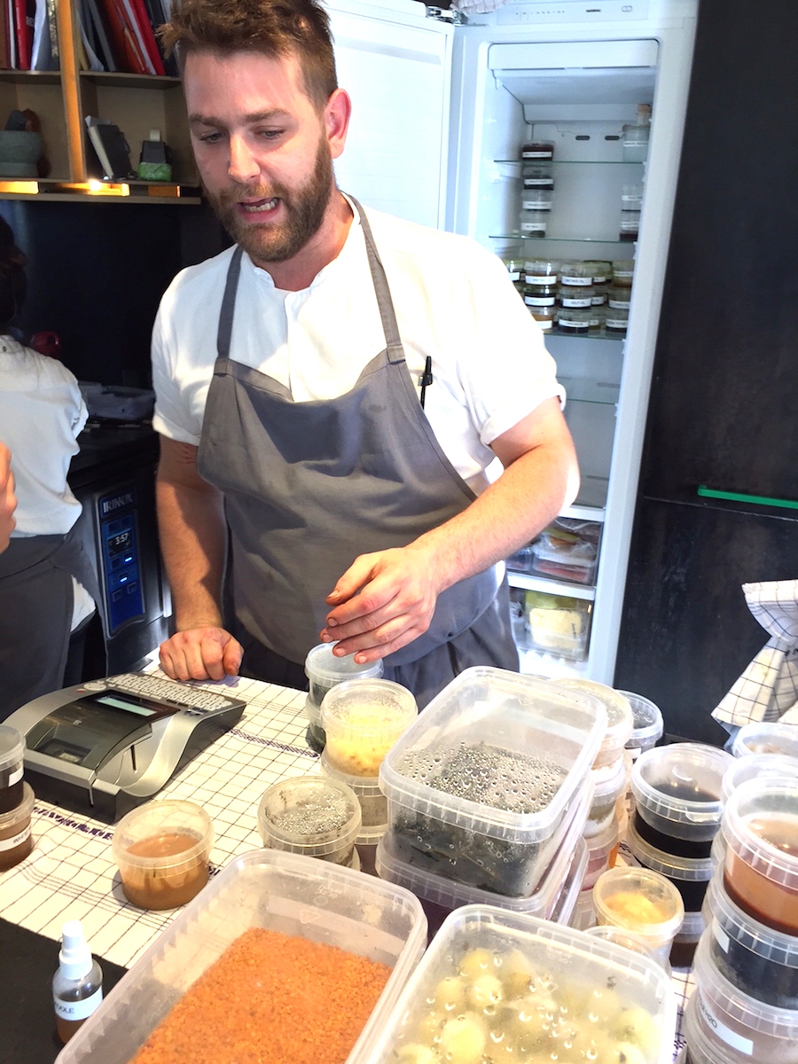 Galleria fotografica






L'edificio che ospita il Noma in una splendida giornata di sole lo scorso sabato 27 agosto, vigilia della quinta edizione di MAD5









Come in un qualsiasi ristorante di mare delle coste italiane e del mondo, il vassoio del pescato (in questo caso nei mari del Nord) viene portato al tavolo e spiegato









First apple of the new season, la prima mela della nuova stagione, una Golden skin per la precisione, per aprire un pranzo superlativo









Una volta aperta, colpo d'occhio a parte, ecco sferette di mela immerse in uno sciroppo di rose e mele fermentate due anni. La fermentazione è una parola dalla quale lì - e non solo lì - proprio non si può prescindere.









Senza parole, così siamo rimasti davanti a questi quattro frutti di fine stagione: in basso a destra (e poi in senso orario) una prugna avvolta in una pellicola naturale, nocciola fresca immersa in olio di nocciola, rosa canina ripiena di frutti di bosco e un fiore di nasturzio farcito con un ribes bacca nera









Un'immagine ravvicinata dei quattro assaggi. Sorprendente il rumore secco della nocciola schiacciata tra i denti. Quattro strepitose idee per accompagnare cocktail vegetariani









Bacche di gelsi, ma di gelsi speciali, quelli che crescono sull'isola di Bornholm, isola danese posta a oriente rispetto al nucleo principale del regno scandinavo, tra le coste della Svezia e della Polonia









Radish pie, tortino di ravanelli. Tale la bellezza del piatto che poteva facilmente deludere. Così non è stato









Chi ha portato in tavola questa preparazione, chiedendo scusa sorridendo, l'ha presentata come una sorta di caprese per via dei pomodorini essiccati e della cagliata di latte fresco. Per il Noma un passo importante: per la prima volta il pomodoro fa capolino nel suo menù. A completare il tutto ribes bianco e ribes nero, olio di colza.









A light stew of fruit and vegetables, così si chiama questa bontà. Dominano le fave e il profumo d'insieme è dato da una estrazione di ciliege









Capolavoro: Sea urcin and cabbage, ricci di mare e cavolo dove una foglia di cavolo svolge la funzione della pasta sfoglia, all'uovo e non, e il ripieno è di ricci in purezza, carnosi e intensi. Arrivano dalle acque gelide dei mari oltre Capo Nord









Un dettaglio del ravioli ai ricci di mare









Langoustine, onion and lavander: dopo l'intensità dei ricci un grande e delicato equilibrio tra i profumi di scampi, cipolle e lavanda









Superbo e godurioso granchio reale prima passato al vapore e poi spadellato con burro aromatizzato agli scampi, le teste per la precisione. Il tutto gustato con le mani









Un esterno del Noma, con il ponte sullo sfondo e tanta gente a camminare rilassata tutt'attorno









Crisp of wild plums and peas, croccante (l'ho sbriciolato al primo morso) con prugne selvatiche e piselli. Ottimo tocco finale con i fiori del timo e del limone









Crisp of wild plum and peas, tanto per ribadire bellezza e bontà









Steamed king crab and egg yolk sauce, la polpa del granchio reale cotta al vapore e servita in un'ardita salsa al tuorlo. Un piatto da meditazione









A ogni cambio di portata il cambio delle posate. Davanti a noi un coltello da Fiorentina e il cervello è andato immediatamente in quella direzione. Poi ecco Charred greens with a scallop paste, foglie di varia natura essiccate alla griglia e spennellate con una pasta di cappesante. E il coltello Laguiole? Una provocazione, ovvio.









#MADMAD5, tanto per non scordarsi perché eravamo a Copenhagen









Nasturzio, gamberi e funghi ma è un mio nome di fantasia perché questa straordinaria minestra non è ancora in carta tanto che non è stata riportata nel menù ricapitolativo che viene consegnato all'uscita.









Un dettaglio della precedente pietanza, qualcosa di stregante: ravioli di foglie di nasturzio e ripieno di gamberetti









Momento di relax, plin plin









Rombo grigliato e salsa di gamberi dolci. Immaginatevi una mini costata di mare, un incredibile giocare tra la sapidità del rombo, la sua gelatinosità e la grassezza esaltata dal calore









Foto ricordo con Renè Redzepi per Cesare Battisti e Cristina Bowerman. Attenti: mad in inglese vuole dire matto, ma in danese cibo.









Ingresso nel mondo dolce con A dessert of sheep's milk and ant paste, latte di pecora e pasta di formiche. Il verde è dato dall'acetosella e lo zucchero è di canna. Per me le formiche sono puro marketing









Il Mottarello del Noma: Grilled rose ice cream and elderflower, fiore di sambuco. E il gelato usato per copertura non è di cioccolato come è facile credere, bensì di orzo fermentato









Spettacolo: muschio cotto nel cioccolato e ciocco-porcino.









In Italia uno pensa subito al Vov, a un liquore all'uovo e non ci si sbaglia. Il tutto con l'aggiunta di sambuco e acquavite al Gewürztraminer









Un ottimo digestivo









Ecco l'orto del Noma, cassette poste sui tetti dei container usati per le fermentazioni. In Italia non sarebbero autorizzate, in pratica a prescindere da come uno lavora. Nella capitale danese sei controllato, ma ti lasciano vivere e lavorare senza risultari vessatori con interventi penalizzanti









Edoardo Canella, sous-chef patavino, spiega a Cristina Bowerman e Cesare Battisti le fermentazioni









Garum di sangue di maiale. Da noi una lavorazione impossibile









La sala al primo piano per eventi privati









La pulizia delle nocciole









L'altra faccia del tortino di ravanelli, un cuoco che deve fare a mano, ogni giorno, decine e decine di piccoli coni uguali tra loro. Senza mai sbuffare e perdere la concentrazione









Un dettaglio della lavorazione dei ravanelli









Poi tutto via per il servizio della sera









Il salone al primo piano dove nascono i piatti. E tanto altro ancora. Non ho visto piastre a induzione o fornelli a gas. Anche al piano terra, quello del ristorante vero e proprio









L'angolo del salone dove pranza e cena il personale






