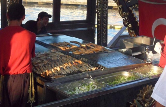 Galleria fotograficaBoğazi&ccedil;i K&ouml;pr&uuml;s&uuml;, il ponte sul Bosforo che unisce i due continentiTornati recentemente a Istanbul dopo alcuni anni di assenza, abbiamo notato con piacere un netto risveglio (o una nascita tout court) dello spirito gourmand &ldquo;all&rsquo;occidentale&rdquo; in citt&agrave;. E&rsquo; un fiorire di iniziative, spazi, proposte, stili che superano quel certo anonimato vagamente mediocre che caratterizzava fino a non molto tempo fa anche le tavole di maggior prestigio &ndash; o la schietta ruralit&agrave; della cucina basic. C&rsquo;&egrave; sempre stata cultura del cibo, oggi cresce anche la capacit&agrave; di comunicarla e renderla fruibile a chi giunge da queste parti per qualche giorno di vacanza. Sono d&rsquo;aiuto anche parecchi siti o blog di foodies turchi, che offrono consigli utilissimi, su tutti istanbuleats.com. (in foto, un piatto del talentuoso chef Mehmet G&uuml;rs, gi&agrave; presentato a Identit&agrave; Golose 2011: Dessert di zucca candita, marinata 24 ore in acqua di calce, con gelato di pistacchio e sciroppo di sesamo)Ogni discettazione sull&rsquo;alta cucina istanbuliota trova l&rsquo;alfa e l&rsquo;omega al diciottesimo piano del Marmara Pera, elegante hotel che ospita il miglior ristorante di Turchia, Mikla, regno di Mehmet G&uuml;rs (nella foto). La stessa sua biografia ne fa il rappresentante perfetto della Istanbul sfaccettata della quale abbiamo accennato: pap&agrave; turco, mamma finlandese, nonna svedese, l&rsquo;infanzia trascorsa a Tammisaari, 90 chilometri da Helsinki, scuola alberghiera a Providence, Rhode Island, Usa. E&rsquo; il profeta della New Anatolian CuisineLa vista che si gode dalle finestre di Mikla &ndash; se c&rsquo;&egrave; bel tempo e la temperatura lo consente si pu&ograve; cenare anche in terrazza, sotto le stelle &ndash; &egrave; meravigliosa: le luci della citt&agrave; ai vostri piedi, a milioni, il Corno d&rsquo;Oro col traffico di battelli, sull&rsquo;altra sponda il vecchio quartiere di Sultanahmet, il Topkapi, Santa Sofia, pi&ugrave; in l&agrave; i minareti della Moschea Blu, a destra la S&uuml;leymaniye Camii, moschea di Solimano... Imperdibile. Ma prima di accomodarvi al tavolo salite ancora d&rsquo;un piano, al diciannovesimo e ultimo, per godervi una flute di champagne (o, dopo cena, un cocktail), magari appoggiati alla balaustra con panorama sull&rsquo;infinito, il cielo come soffitto, la mente che spazia liberaMehmet G&uuml;rs segue in fondo &ldquo;solo&rdquo; le tracce di chi (penso ad Alex Atala in Brasile, Ren&eacute; Redzepi in Danimarca, Gast&oacute;n Acurio in Per&ugrave;...) un bel giorno decide di fare delle proprie radici culinarie un poco disconosciute, dei prodotti di farmers a chilometro zero o mille, ma comunque del territorio (che se &egrave; l&rsquo;Amazzonia, &egrave; un territorio gigantesco. E anche la Turchia non scherza), il punto di partenza per reinventare una tradizione. Il suo menu &egrave; proprio, innanzi tutto, un inno alle materie prime scovate nei pi&ugrave; remoti angoli in un Paese di 780mila chilometri quadrati, ossia pi&ugrave; di due volte e mezza l&rsquo;Italia: gli agnelli Kıvırcık allevati in Tracia, una sorta di gruviera che viene dall&rsquo;Anatolia del Nordest, i vini della Cappadocia, i pistacchi da Gaziantep, la marmellata di lavanda selvatica ancora prodotta dalle donne di un villaggetto non lontano da Smirne... Menu degustazione a 140 lire turche, 210 col wine pairing (sono rispettivamente 55 e 83 euro)Nella foto, un antipasto che &egrave; una sorta di riassunto perfetto di come la tradizione possa essere reinventata in modo creativo, creando un piatto che &egrave; intimamente turco eppure al 100% partorito dalla mente di G&uuml;rs. Sardine crisp, lemon &egrave; la reinterpretazione di un classico street food istanbuliota di cui parleremo tra poco, il panino col pesce del mar Nero e un goccio di succo di limone che si compra ancor oggi facendo la fila davanti ai barconi ancorati vicino al ponte di GalataEcco un piatto che invece &egrave; solo accostamento di prodotti selezionati, pura materia. Dried beef, ossia una carne di manzo a m&ograve; di bresaola, con il Kars gravyer, formaggio vaccino che &egrave; una sorta di gruviera stagionato circa 10 mesi e proveniente da Kars, citt&agrave; a poca distante dal confine armeno, famosa per i suoi pascoli e bestiameIl piatto della serata, che &egrave; ormai un cavallo di battaglia dello chef, &egrave; la spalla di agnello Kıvırcık, cotta sottovuoto per 24 ore a bassa temperatura, accompagnato da un pilaf &nbsp;&ldquo;umido&rdquo; di farro, pestil di prugna e melassa di melogranoDetto di G&uuml;rs, un weekend gastronomico a Istanbul offre anche molto altro. La cosa pi&ugrave; divertente &egrave; uscire dalle zone turistiche per scoprire indirizzi nascosti, magari sfacciatamente retr&ograve; ma custodi di luminose pepite del gusto. Come Pando, negozietto anonimo nel bel quartiere di Besiktas, Mumcu Bakkal Sokok 5, dove andare a far colazione o uno spuntino veloce per pranzo, magari seduti placidamente ai tavolini apparecchiati sulla strada chiusa al traffico dove fervono le pi&ugrave; disparate attivit&agrave; commerciali. Ad accogliervi sar&agrave; lo stesso Pando, un incredibile vecchietto 85enne d&rsquo;origine bulgara che prima vi scruter&agrave; con curiosit&agrave; e poi vi delizier&agrave; con un sorriso. E non solo&hellip;&Egrave; il regno del kaimak, versione turco-balcanica della nostra panna, ottenuto dalla fermentazione del grasso estratto durante la cottura del latte crudo vaccino. Fresco &ndash; come in questo caso &ndash; ha un gusto pi&ugrave; dolce. Viene quindi servito accompagnato da miele e pane bianco, per uno spuntino paradisiaco, specie se preceduto &ndash; come sar&agrave; lo stesso Pando a suggerirvi &ndash; da un paio di uova freschissime cotte al tegamino, per dare anche una nota salata alla vostra colazione. Il negozio &egrave; aperto dal 1895 e i prezzi sembrano rimasti quelli di allora: kaimak col miele, pane, uova (buonissime!) al tegamino e un t&eacute; o un caff&eacute; a 10 lire turche, poco meno di 4 euroUn altro indirizzo prezioso: Kiblecesme Caddesi 96, a Kantarcilar (Kucuk Pazari), nel quartiere di Eminonu, un poco fuori mano anche questo. Ci troviamo in un dedalo di viuzze polverose e di caravanserragli di epoca ottomana non lontani dal Corno d&rsquo;Oro: diciamo che il modo pi&ugrave; facile per raggiungerlo &egrave; scendervi &ndash; puntando verso il mare - dopo aver visitato la S&uuml;leymaniye Camii. Qui &egrave; Altan Sekerleme, bottega di dolciumi, un po&rsquo; fan&eacute; ma che trasuda autenticit&agrave;. Di propriet&agrave; della stessa famiglia da quattro generazioni, banconi di marmo, espositori di legno usurato: il tempo da queste parti sembra essersi fermatoSe avete gi&agrave; assaggiato una scatola di lokum, anche detti turkish delight (cos&igrave; li chiamarono gli inglesi, che per primi li portarono in Europa), magari di fattura industriale e comprata all&rsquo;ultimo momento in aeroporto, avete solo una vaga di idea di cosa siano questi dolcetti antichissimi (venivano prodotti gi&agrave; nel XV secolo lavorando la melassa e il miele, oggi sostituiti da amido e zucchero). Sono quadrotti di consistenza gelatinosa, che invitano al morso, aromatizzati  - qui da Altan con deliziosi aromi fatti in casa &ndash; nei modi pi&ugrave; svariati: alla rosa canina, ai frutti rossi, al limone, alla cannella, alle spezie.... A volte racchiudono una gemma croccante di pistacchio, mandorla o nocciola; sono ricoperti di zucchero a velo o cocco grattugiato. Impossibile non comprarne almeno una scatola, visti anche i prezzi (10 lire turche al chilo, meno di 4 euro; qualcosa in pi&ugrave; la variante al pistacchio o alla mandorla). Da Altan sono prodotti anche buonissimi dolcetti di mandorla (nella foto) e caramelle artigianaliUn posto come &Ccedil;iya Sofrası (G&uuml;neşli Bah&ccedil;e Sokak 43) piacerebbe enormemente a Carlin Petrini: &egrave; il luogo della tradizione riscoperta. E&rsquo; entrato anche nei nostri cuori, intanto perch&eacute; si trova a Kadik&ouml;y, sponda asiatica, almeno mezz&rsquo;ora di taxi (ma tanto costano pochissimo), quartiere del tutto fuori dai giri turistici ma di splendida autenticit&agrave;: una Istanbul vera, vivace, vitale, che ama uscire la sera (&egrave; un susseguirsi di ristorantini, caff&eacute;, pasticcerie, chioschi da street food...) e mangiare bene. Qualcuno considera addirittura &Ccedil;iya il miglior ristorante in citt&agrave;: di certo &egrave; uno spettacolo ammirare la serie infinita di squisite pietanze nei pentoloni, gi&agrave; pronte per essere servite, tra le quali scegliere i vostri molteplici assaggi, a prezzi a dir poco irrisori (si cena pantagruelicamente, bevendo birra, per 15-20 lire turche, 6-8 euro)Sia chiaro: &Ccedil;iya &egrave; una trattoriaccia con banconi di legno, cibo pronto e servizio avventuroso. Ma la qualit&agrave; &egrave; eccellente e qui davvero potrete sbizzarrirvi creando da soli una sorta di menu degustazione tra i pi&ugrave; tipici piatti turchi (le verdure sono tutte da urlo). Inutile elencarvi i piatti: sono decine e cambiano di continuo a seconda della stagione e del mercato. Costituiscono una sorta di compendio delle cucine regionali grazie all&rsquo;opera instancabile del proprietario e chef Musa Dagdeviren, originario della citt&agrave; sud-orientale di Gaziantep e sorta di antropologo culinario: raccoglie e pubblica ricette da tutto il Paese e pubblica persino una rivista dedicata alla cultura del cibo turco (Yemek ve Kultur). Di fronte a &Ccedil;iya Sofrası &egrave; &Ccedil;iya Kebap, figlioccio ancor pi&ugrave; easy tutto dedito al tipico piatto turco-arabo a base di carne. E per un perfetto dopocena, sempre in zona, c&rsquo;&egrave; Fazil Bey (Serasker Caddesi 1), che vi aiuter&agrave; a superare ogni possibile pregiudizio attorno al turkish coffee