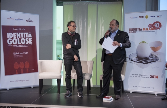 Galleria fotografica






La settima edizione della Guida Identità Golose ai ristorante d'autore in Italia e nel mondo









La sala gremita del Magna Pars Suite MIlano in via Forcella 6 a Milano








I Migliori chef per la Guida di Identità Golose 2014 sono Alessandro Negrini e Fabio Pisani de Il Luogo di Aimo e Nadia a Milano. Con loro sul palco, il sommelier Nicola Dell'Agnolo e Stefania Moroni. A premiarli Carlo Bianchi, area manager di Cavit. A destra, Paolo Marchi, curatore della Guida di Identità 2014.








Alessandro Negrini e Fabio Pisani "depositano" la loro impronta d'autore








La Migliore chef donna è Sara Preceruti de La Locanda del Notaio di Pellio Intelvi (Como), menzione speciale Sognatori del Gusto. Premia Marco Barbieri, International Relations Team di S.Pellegrino.








Sara Preceruti








Paolo Marchi con Oscar Farinetti, autore della prefazione della guida








Il Miglior chef straniero 2014 è Kobe Desramaults del ristorante In de Wulf a Heuvelland nelle Fiandre, in Belgio. Premia Serena Stefanoni de il Consorzio Grana Padano. Con loro Gabriele Zanatta (a sinistra), caporedattore della guida, e Paolo Marchi








Kobe Desramaults








Il Miglior sous chef è Alessandro Procopio del ristorante D’O di Cornaredo (Milano), chef Davide Oldani (in foto, a sinistra). È premiato da Sara Peirone, responsabile Top Gastronomy di Lavazza.








Paolo Marchi con Carlo Cracco, autore della prefazione dolce





