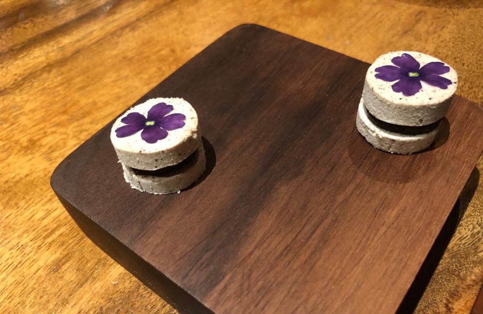 Photogallery






The sign appearing on Soi Langsuan in Bangkok, the little road where you can find restaurant Gaggan and, in front of it, the new-born Gaa, same ownership









The entrance to the restaurant, which recently got the second Michelin star. It’s open only in the evening. There are 65 people here who serve 100 clients daily, divided into two shifts (photo from themalaymailonline.com)









Gaggan’s famous emoji menu: "We first create the dish, then we sum it up with an emoji", he points out (photo from Andershusa/Instagram)









1 
Pink elderflower and watermelon
The tasting menu starts with the notes of the Foo Fighters. The entire first part of the menu is to be eaten with your hands: "This is how it works in India", he explains. First dish: a pearl among elderberry flowers and watermelon in an edible oyster shell. A debut to rinse the palate









2
Yogurt Explosion
Gaggan’s most famous dish. It’s the result of his early internship at elBulli in Roses, Catalonia. "If Ferran Adrià has had Spanish people accept a spherified olives", he says, "why shouldn’t I do the same with an emblem of India?". The spherified yogurt is made with low fat yogurt dipped in a sodium alginate









3
Lick it up. Mushroom peas
With "Lick it up", a hit from the Eighties by Kiss playing in the background, they serve this dish which you must hold with both hands and lick. The sauces, from bottom to top, in "licking order ": tomato, dehydrated mushrooms and mashed green chickpeas. On top, shaved truffle.  "Music, words, food. This is how we represent lightness"









Gaggan holds a cone









4
Tom Yum Kung
This is his version of Tom Yam (or Yum), a popular Thai soup. It’s a cold purée of tom yam served in crispy rice paper with a head of scampi to add flavour. It’s a sort of prawn cocktail in the shape of a cone









5
Goat brain, flower power
A cracker of goat brain ("to us Indians, it’s like foie gras", beams Gaggan) and rice flour. It is served to women first, playing with the similar sounds of flour and flower






