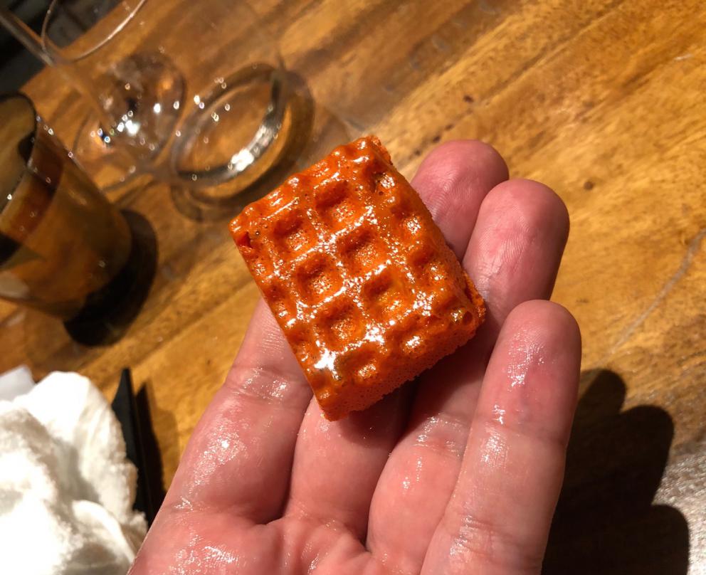 Photogallery






The sign appearing on Soi Langsuan in Bangkok, the little road where you can find restaurant Gaggan and, in front of it, the new-born Gaa, same ownership









The entrance to the restaurant, which recently got the second Michelin star. It’s open only in the evening. There are 65 people here who serve 100 clients daily, divided into two shifts (photo from themalaymailonline.com)









Gaggan’s famous emoji menu: "We first create the dish, then we sum it up with an emoji", he points out (photo from Andershusa/Instagram)









1 
Pink elderflower and watermelon
The tasting menu starts with the notes of the Foo Fighters. The entire first part of the menu is to be eaten with your hands: "This is how it works in India", he explains. First dish: a pearl among elderberry flowers and watermelon in an edible oyster shell. A debut to rinse the palate









2
Yogurt Explosion
Gaggan’s most famous dish. It’s the result of his early internship at elBulli in Roses, Catalonia. "If Ferran Adrià has had Spanish people accept a spherified olives", he says, "why shouldn’t I do the same with an emblem of India?". The spherified yogurt is made with low fat yogurt dipped in a sodium alginate









3
Lick it up. Mushroom peas
With "Lick it up", a hit from the Eighties by Kiss playing in the background, they serve this dish which you must hold with both hands and lick. The sauces, from bottom to top, in "licking order ": tomato, dehydrated mushrooms and mashed green chickpeas. On top, shaved truffle.  "Music, words, food. This is how we represent lightness"









Gaggan holds a cone









4
Tom Yum Kung
This is his version of Tom Yam (or Yum), a popular Thai soup. It’s a cold purée of tom yam served in crispy rice paper with a head of scampi to add flavour. It’s a sort of prawn cocktail in the shape of a cone









5
Goat brain, flower power
A cracker of goat brain ("to us Indians, it’s like foie gras", beams Gaggan) and rice flour. It is served to women first, playing with the similar sounds of flour and flower









6
Eggplant cookie
A cookie of aubergine, a sandwich the size of a coin, held together thanks to some onion chutney. "Out of 20, in Asia ingredients are usually worth 5, technique 15. With this dish I wanted to go in the opposite direction, return to Western minimalism with a universal emblem, that is to say aubergines. It’s a recent dish, which portraits the restaurant as it is now"









7
Chilly bon bon
Chilli pepper spheres. "Chocolates" filled with cumin, chilli pepper, ginger, and other spices. "In India there are four degrees of spiciness: hot, hotter, very hot and hell". The bon bon was mildly hot









8
Idly Sambar
Idly Sambar is a Tamil recipe, from the south of India: vegetable stew, tamarind and varying spices. "The world can be divided into two: those who eat rice, and those who eat bread. In this case, the base is bread made of fermented rice"









9
Banana chicken liver
"My daughter is one year and a half old. She’s difficult when it comes to eating. Give this combination to your children and they’ll be happy"









10
Fish Granola
Granola with fried seabass, walnuts and cheese cream









11
Gin tonic cucumber uni
Sea urchin cones, temaki, key lime and Indian tonic water. "This dish is the result of my trips to Japan: I went there 74 times only in the last couple of years. It has sea urchins from Hokkaido, in the north. In India we never eat raw food". The nori seaweed is made with dill









The selection of sea urchins from Hokkaido. "It’s worth its weight in gold", sighs Gaggan









12
Chutoro sushi
This is Gaggan’s homage to Tuna nigiri, an emblem of his future homeland (in 2021 after closing in Bangkok he’ll open a completely different restaurant in Fukuoka, Japan). Chutoro is a medium-fat tuna. In this case it is caramelised, adding a little emulsion of yuzu on top. The interesting part is below: it’s not rice, but a meringue made of all the ingredients used in sushi, that is to say vinegar, rice, sugar. "Sushi is a one way trip. You’ll never return. Nobody told me how to make it. This dish is a new take on a very personal memory"






