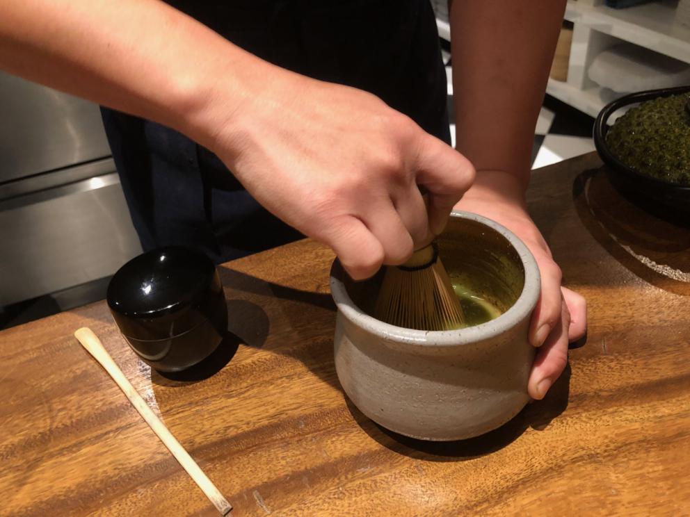 Photogallery






The sign appearing on Soi Langsuan in Bangkok, the little road where you can find restaurant Gaggan and, in front of it, the new-born Gaa, same ownership









The entrance to the restaurant, which recently got the second Michelin star. It’s open only in the evening. There are 65 people here who serve 100 clients daily, divided into two shifts (photo from themalaymailonline.com)









Gaggan’s famous emoji menu: "We first create the dish, then we sum it up with an emoji", he points out (photo from Andershusa/Instagram)









1 
Pink elderflower and watermelon
The tasting menu starts with the notes of the Foo Fighters. The entire first part of the menu is to be eaten with your hands: "This is how it works in India", he explains. First dish: a pearl among elderberry flowers and watermelon in an edible oyster shell. A debut to rinse the palate









2
Yogurt Explosion
Gaggan’s most famous dish. It’s the result of his early internship at elBulli in Roses, Catalonia. "If Ferran Adrià has had Spanish people accept a spherified olives", he says, "why shouldn’t I do the same with an emblem of India?". The spherified yogurt is made with low fat yogurt dipped in a sodium alginate









3
Lick it up. Mushroom peas
With "Lick it up", a hit from the Eighties by Kiss playing in the background, they serve this dish which you must hold with both hands and lick. The sauces, from bottom to top, in "licking order ": tomato, dehydrated mushrooms and mashed green chickpeas. On top, shaved truffle.  "Music, words, food. This is how we represent lightness"









Gaggan holds a cone









4
Tom Yum Kung
This is his version of Tom Yam (or Yum), a popular Thai soup. It’s a cold purée of tom yam served in crispy rice paper with a head of scampi to add flavour. It’s a sort of prawn cocktail in the shape of a cone









5
Goat brain, flower power
A cracker of goat brain ("to us Indians, it’s like foie gras", beams Gaggan) and rice flour. It is served to women first, playing with the similar sounds of flour and flower









6
Eggplant cookie
A cookie of aubergine, a sandwich the size of a coin, held together thanks to some onion chutney. "Out of 20, in Asia ingredients are usually worth 5, technique 15. With this dish I wanted to go in the opposite direction, return to Western minimalism with a universal emblem, that is to say aubergines. It’s a recent dish, which portraits the restaurant as it is now"









7
Chilly bon bon
Chilli pepper spheres. "Chocolates" filled with cumin, chilli pepper, ginger, and other spices. "In India there are four degrees of spiciness: hot, hotter, very hot and hell". The bon bon was mildly hot









8
Idly Sambar
Idly Sambar is a Tamil recipe, from the south of India: vegetable stew, tamarind and varying spices. "The world can be divided into two: those who eat rice, and those who eat bread. In this case, the base is bread made of fermented rice"









9
Banana chicken liver
"My daughter is one year and a half old. She’s difficult when it comes to eating. Give this combination to your children and they’ll be happy"









10
Fish Granola
Granola with fried seabass, walnuts and cheese cream









11
Gin tonic cucumber uni
Sea urchin cones, temaki, key lime and Indian tonic water. "This dish is the result of my trips to Japan: I went there 74 times only in the last couple of years. It has sea urchins from Hokkaido, in the north. In India we never eat raw food". The nori seaweed is made with dill









The selection of sea urchins from Hokkaido. "It’s worth its weight in gold", sighs Gaggan









12
Chutoro sushi
This is Gaggan’s homage to Tuna nigiri, an emblem of his future homeland (in 2021 after closing in Bangkok he’ll open a completely different restaurant in Fukuoka, Japan). Chutoro is a medium-fat tuna. In this case it is caramelised, adding a little emulsion of yuzu on top. The interesting part is below: it’s not rice, but a meringue made of all the ingredients used in sushi, that is to say vinegar, rice, sugar. "Sushi is a one way trip. You’ll never return. Nobody told me how to make it. This dish is a new take on a very personal memory"









13
Foie gras yuzu carrot
Carrot tartelette filled with foie gras. There’s no sweat on the hand: before the tasting they spray yuzu on the palm









Recipe number 14, another excursus between Japan and India









The dish is finished at the table






