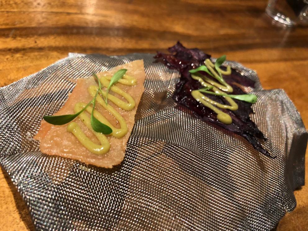 Photogallery






The sign appearing on Soi Langsuan in Bangkok, the little road where you can find restaurant Gaggan and, in front of it, the new-born Gaa, same ownership









The entrance to the restaurant, which recently got the second Michelin star. It’s open only in the evening. There are 65 people here who serve 100 clients daily, divided into two shifts (photo from themalaymailonline.com)









Gaggan’s famous emoji menu: "We first create the dish, then we sum it up with an emoji", he points out (photo from Andershusa/Instagram)









1 
Pink elderflower and watermelon
The tasting menu starts with the notes of the Foo Fighters. The entire first part of the menu is to be eaten with your hands: "This is how it works in India", he explains. First dish: a pearl among elderberry flowers and watermelon in an edible oyster shell. A debut to rinse the palate









2
Yogurt Explosion
Gaggan’s most famous dish. It’s the result of his early internship at elBulli in Roses, Catalonia. "If Ferran Adrià has had Spanish people accept a spherified olives", he says, "why shouldn’t I do the same with an emblem of India?". The spherified yogurt is made with low fat yogurt dipped in a sodium alginate









3
Lick it up. Mushroom peas
With "Lick it up", a hit from the Eighties by Kiss playing in the background, they serve this dish which you must hold with both hands and lick. The sauces, from bottom to top, in "licking order ": tomato, dehydrated mushrooms and mashed green chickpeas. On top, shaved truffle.  "Music, words, food. This is how we represent lightness"









Gaggan holds a cone









4
Tom Yum Kung
This is his version of Tom Yam (or Yum), a popular Thai soup. It’s a cold purée of tom yam served in crispy rice paper with a head of scampi to add flavour. It’s a sort of prawn cocktail in the shape of a cone









5
Goat brain, flower power
A cracker of goat brain ("to us Indians, it’s like foie gras", beams Gaggan) and rice flour. It is served to women first, playing with the similar sounds of flour and flower









6
Eggplant cookie
A cookie of aubergine, a sandwich the size of a coin, held together thanks to some onion chutney. "Out of 20, in Asia ingredients are usually worth 5, technique 15. With this dish I wanted to go in the opposite direction, return to Western minimalism with a universal emblem, that is to say aubergines. It’s a recent dish, which portraits the restaurant as it is now"









7
Chilly bon bon
Chilli pepper spheres. "Chocolates" filled with cumin, chilli pepper, ginger, and other spices. "In India there are four degrees of spiciness: hot, hotter, very hot and hell". The bon bon was mildly hot









8
Idly Sambar
Idly Sambar is a Tamil recipe, from the south of India: vegetable stew, tamarind and varying spices. "The world can be divided into two: those who eat rice, and those who eat bread. In this case, the base is bread made of fermented rice"









9
Banana chicken liver
"My daughter is one year and a half old. She’s difficult when it comes to eating. Give this combination to your children and they’ll be happy"









10
Fish Granola
Granola with fried seabass, walnuts and cheese cream









11
Gin tonic cucumber uni
Sea urchin cones, temaki, key lime and Indian tonic water. "This dish is the result of my trips to Japan: I went there 74 times only in the last couple of years. It has sea urchins from Hokkaido, in the north. In India we never eat raw food". The nori seaweed is made with dill









The selection of sea urchins from Hokkaido. "It’s worth its weight in gold", sighs Gaggan









12
Chutoro sushi
This is Gaggan’s homage to Tuna nigiri, an emblem of his future homeland (in 2021 after closing in Bangkok he’ll open a completely different restaurant in Fukuoka, Japan). Chutoro is a medium-fat tuna. In this case it is caramelised, adding a little emulsion of yuzu on top. The interesting part is below: it’s not rice, but a meringue made of all the ingredients used in sushi, that is to say vinegar, rice, sugar. "Sushi is a one way trip. You’ll never return. Nobody told me how to make it. This dish is a new take on a very personal memory"









13
Foie gras yuzu carrot
Carrot tartelette filled with foie gras. There’s no sweat on the hand: before the tasting they spray yuzu on the palm









Recipe number 14, another excursus between Japan and India









The dish is finished at the table









Whisking the mixture









14
Green vegetable matcha
Green apple gazpacho, cucumber and matcha tea. "I first fell in love with Japan thanks to tea. This looks like Japan but tastes of India and represents Gaggan"









15
Pork Vindaloo 
Vindaloo is a recipe from Goa, the Portuguese feud in west India. It’s pork, seasoned with garlic, vinegar and hot chilli pepper. In this case the fried texture is super-crispy, enriched with Japanese mustard which gives value to the Iberian pig marinated in wine and spices









New dishing out at the Chef's Table









16
Scallop uncooked curry
Scallops with green chilli, fried shallot and coconut ice cream. A “fake-curry ". The dish is served with a complaint about the past: "It’s the British who brought curry. It’s not part of our heritage, just like Chicken tikka masala. For me curry is a universal flavour, suitable for everything"









You can enrich the curry with two chilli sauces: the green, sweeter one (make love) or the red hot one (sex). "I come front the country that invented Kamasutra"









17
Sheek Kebab
A mini-sausage that’s a new take on a great Indian classic, sheek kebab. "The sausage is a clear proof of the huge influence that Chinese and Indian cuisine have had on the West. I bought this one from the market, today, and added galang and ginger. (In the photo, you can see the vegetarian version to the right)






