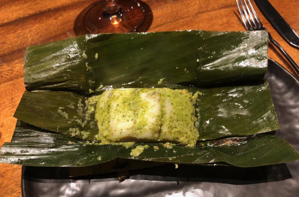 Photogallery






The sign appearing on Soi Langsuan in Bangkok, the little road where you can find restaurant Gaggan and, in front of it, the new-born Gaa, same ownership









The entrance to the restaurant, which recently got the second Michelin star. It’s open only in the evening. There are 65 people here who serve 100 clients daily, divided into two shifts (photo from themalaymailonline.com)









Gaggan’s famous emoji menu: "We first create the dish, then we sum it up with an emoji", he points out (photo from Andershusa/Instagram)









1 
Pink elderflower and watermelon
The tasting menu starts with the notes of the Foo Fighters. The entire first part of the menu is to be eaten with your hands: "This is how it works in India", he explains. First dish: a pearl among elderberry flowers and watermelon in an edible oyster shell. A debut to rinse the palate









2
Yogurt Explosion
Gaggan’s most famous dish. It’s the result of his early internship at elBulli in Roses, Catalonia. "If Ferran Adrià has had Spanish people accept a spherified olives", he says, "why shouldn’t I do the same with an emblem of India?". The spherified yogurt is made with low fat yogurt dipped in a sodium alginate









3
Lick it up. Mushroom peas
With "Lick it up", a hit from the Eighties by Kiss playing in the background, they serve this dish which you must hold with both hands and lick. The sauces, from bottom to top, in "licking order ": tomato, dehydrated mushrooms and mashed green chickpeas. On top, shaved truffle.  "Music, words, food. This is how we represent lightness"









Gaggan holds a cone









4
Tom Yum Kung
This is his version of Tom Yam (or Yum), a popular Thai soup. It’s a cold purée of tom yam served in crispy rice paper with a head of scampi to add flavour. It’s a sort of prawn cocktail in the shape of a cone









5
Goat brain, flower power
A cracker of goat brain ("to us Indians, it’s like foie gras", beams Gaggan) and rice flour. It is served to women first, playing with the similar sounds of flour and flower









6
Eggplant cookie
A cookie of aubergine, a sandwich the size of a coin, held together thanks to some onion chutney. "Out of 20, in Asia ingredients are usually worth 5, technique 15. With this dish I wanted to go in the opposite direction, return to Western minimalism with a universal emblem, that is to say aubergines. It’s a recent dish, which portraits the restaurant as it is now"









7
Chilly bon bon
Chilli pepper spheres. "Chocolates" filled with cumin, chilli pepper, ginger, and other spices. "In India there are four degrees of spiciness: hot, hotter, very hot and hell". The bon bon was mildly hot









8
Idly Sambar
Idly Sambar is a Tamil recipe, from the south of India: vegetable stew, tamarind and varying spices. "The world can be divided into two: those who eat rice, and those who eat bread. In this case, the base is bread made of fermented rice"









9
Banana chicken liver
"My daughter is one year and a half old. She’s difficult when it comes to eating. Give this combination to your children and they’ll be happy"









10
Fish Granola
Granola with fried seabass, walnuts and cheese cream









11
Gin tonic cucumber uni
Sea urchin cones, temaki, key lime and Indian tonic water. "This dish is the result of my trips to Japan: I went there 74 times only in the last couple of years. It has sea urchins from Hokkaido, in the north. In India we never eat raw food". The nori seaweed is made with dill









The selection of sea urchins from Hokkaido. "It’s worth its weight in gold", sighs Gaggan









12
Chutoro sushi
This is Gaggan’s homage to Tuna nigiri, an emblem of his future homeland (in 2021 after closing in Bangkok he’ll open a completely different restaurant in Fukuoka, Japan). Chutoro is a medium-fat tuna. In this case it is caramelised, adding a little emulsion of yuzu on top. The interesting part is below: it’s not rice, but a meringue made of all the ingredients used in sushi, that is to say vinegar, rice, sugar. "Sushi is a one way trip. You’ll never return. Nobody told me how to make it. This dish is a new take on a very personal memory"









13
Foie gras yuzu carrot
Carrot tartelette filled with foie gras. There’s no sweat on the hand: before the tasting they spray yuzu on the palm









Recipe number 14, another excursus between Japan and India









The dish is finished at the table









Whisking the mixture









14
Green vegetable matcha
Green apple gazpacho, cucumber and matcha tea. "I first fell in love with Japan thanks to tea. This looks like Japan but tastes of India and represents Gaggan"









15
Pork Vindaloo 
Vindaloo is a recipe from Goa, the Portuguese feud in west India. It’s pork, seasoned with garlic, vinegar and hot chilli pepper. In this case the fried texture is super-crispy, enriched with Japanese mustard which gives value to the Iberian pig marinated in wine and spices









New dishing out at the Chef's Table









16
Scallop uncooked curry
Scallops with green chilli, fried shallot and coconut ice cream. A “fake-curry ". The dish is served with a complaint about the past: "It’s the British who brought curry. It’s not part of our heritage, just like Chicken tikka masala. For me curry is a universal flavour, suitable for everything"









You can enrich the curry with two chilli sauces: the green, sweeter one (make love) or the red hot one (sex). "I come front the country that invented Kamasutra"









17
Sheek Kebab
A mini-sausage that’s a new take on a great Indian classic, sheek kebab. "The sausage is a clear proof of the huge influence that Chinese and Indian cuisine have had on the West. I bought this one from the market, today, and added galang and ginger. (In the photo, you can see the vegetarian version to the right)









18
Thai Green Curry
A crispy wafer made with dehydrated chicken skin with coriander sauce, in a miniaturised version of the traditional Thai green curry. In this case too, the version on the right is vegetarian









Gaggan gets a torch and starts to caramelise the banana leaves









The banana leaf is burning...






