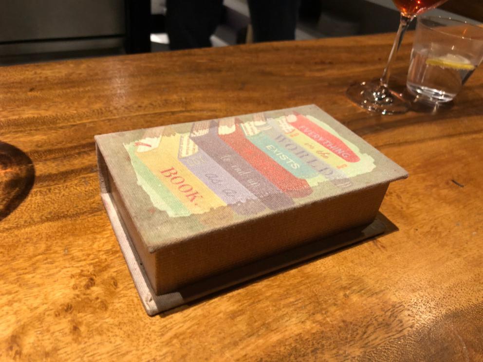 Photogallery






The sign appearing on Soi Langsuan in Bangkok, the little road where you can find restaurant Gaggan and, in front of it, the new-born Gaa, same ownership









The entrance to the restaurant, which recently got the second Michelin star. It’s open only in the evening. There are 65 people here who serve 100 clients daily, divided into two shifts (photo from themalaymailonline.com)









Gaggan’s famous emoji menu: "We first create the dish, then we sum it up with an emoji", he points out (photo from Andershusa/Instagram)









1 
Pink elderflower and watermelon
The tasting menu starts with the notes of the Foo Fighters. The entire first part of the menu is to be eaten with your hands: "This is how it works in India", he explains. First dish: a pearl among elderberry flowers and watermelon in an edible oyster shell. A debut to rinse the palate









2
Yogurt Explosion
Gaggan’s most famous dish. It’s the result of his early internship at elBulli in Roses, Catalonia. "If Ferran Adrià has had Spanish people accept a spherified olives", he says, "why shouldn’t I do the same with an emblem of India?". The spherified yogurt is made with low fat yogurt dipped in a sodium alginate









3
Lick it up. Mushroom peas
With "Lick it up", a hit from the Eighties by Kiss playing in the background, they serve this dish which you must hold with both hands and lick. The sauces, from bottom to top, in "licking order ": tomato, dehydrated mushrooms and mashed green chickpeas. On top, shaved truffle.  "Music, words, food. This is how we represent lightness"









Gaggan holds a cone









4
Tom Yum Kung
This is his version of Tom Yam (or Yum), a popular Thai soup. It’s a cold purée of tom yam served in crispy rice paper with a head of scampi to add flavour. It’s a sort of prawn cocktail in the shape of a cone









5
Goat brain, flower power
A cracker of goat brain ("to us Indians, it’s like foie gras", beams Gaggan) and rice flour. It is served to women first, playing with the similar sounds of flour and flower









6
Eggplant cookie
A cookie of aubergine, a sandwich the size of a coin, held together thanks to some onion chutney. "Out of 20, in Asia ingredients are usually worth 5, technique 15. With this dish I wanted to go in the opposite direction, return to Western minimalism with a universal emblem, that is to say aubergines. It’s a recent dish, which portraits the restaurant as it is now"









7
Chilly bon bon
Chilli pepper spheres. "Chocolates" filled with cumin, chilli pepper, ginger, and other spices. "In India there are four degrees of spiciness: hot, hotter, very hot and hell". The bon bon was mildly hot









8
Idly Sambar
Idly Sambar is a Tamil recipe, from the south of India: vegetable stew, tamarind and varying spices. "The world can be divided into two: those who eat rice, and those who eat bread. In this case, the base is bread made of fermented rice"









9
Banana chicken liver
"My daughter is one year and a half old. She’s difficult when it comes to eating. Give this combination to your children and they’ll be happy"









10
Fish Granola
Granola with fried seabass, walnuts and cheese cream









11
Gin tonic cucumber uni
Sea urchin cones, temaki, key lime and Indian tonic water. "This dish is the result of my trips to Japan: I went there 74 times only in the last couple of years. It has sea urchins from Hokkaido, in the north. In India we never eat raw food". The nori seaweed is made with dill









The selection of sea urchins from Hokkaido. "It’s worth its weight in gold", sighs Gaggan









12
Chutoro sushi
This is Gaggan’s homage to Tuna nigiri, an emblem of his future homeland (in 2021 after closing in Bangkok he’ll open a completely different restaurant in Fukuoka, Japan). Chutoro is a medium-fat tuna. In this case it is caramelised, adding a little emulsion of yuzu on top. The interesting part is below: it’s not rice, but a meringue made of all the ingredients used in sushi, that is to say vinegar, rice, sugar. "Sushi is a one way trip. You’ll never return. Nobody told me how to make it. This dish is a new take on a very personal memory"









13
Foie gras yuzu carrot
Carrot tartelette filled with foie gras. There’s no sweat on the hand: before the tasting they spray yuzu on the palm









Recipe number 14, another excursus between Japan and India









The dish is finished at the table









Whisking the mixture









14
Green vegetable matcha
Green apple gazpacho, cucumber and matcha tea. "I first fell in love with Japan thanks to tea. This looks like Japan but tastes of India and represents Gaggan"









15
Pork Vindaloo 
Vindaloo is a recipe from Goa, the Portuguese feud in west India. It’s pork, seasoned with garlic, vinegar and hot chilli pepper. In this case the fried texture is super-crispy, enriched with Japanese mustard which gives value to the Iberian pig marinated in wine and spices









New dishing out at the Chef's Table









16
Scallop uncooked curry
Scallops with green chilli, fried shallot and coconut ice cream. A “fake-curry ". The dish is served with a complaint about the past: "It’s the British who brought curry. It’s not part of our heritage, just like Chicken tikka masala. For me curry is a universal flavour, suitable for everything"









You can enrich the curry with two chilli sauces: the green, sweeter one (make love) or the red hot one (sex). "I come front the country that invented Kamasutra"









17
Sheek Kebab
A mini-sausage that’s a new take on a great Indian classic, sheek kebab. "The sausage is a clear proof of the huge influence that Chinese and Indian cuisine have had on the West. I bought this one from the market, today, and added galang and ginger. (In the photo, you can see the vegetarian version to the right)









18
Thai Green Curry
A crispy wafer made with dehydrated chicken skin with coriander sauce, in a miniaturised version of the traditional Thai green curry. In this case too, the version on the right is vegetarian









Gaggan gets a torch and starts to caramelise the banana leaves









The banana leaf is burning...









19
Seabass Bengali Mustard
...inside there’s a filet of smoked sea bass with mildly hot Bengali mustard. "It’s my oldest recipe, which is based on the ancestral gesture of man discovering fire. Before I die, I want to eat this"









20
Charcoal lotus stem
Fried aubergine with a stalk of lotus inside. It’s a total black fried snack, which looks similar to charcoal









21
Lobster dosa
Dosa (rice batter) with open lobster, in Indian sauce. You have to close it and eat it like a taco
 






