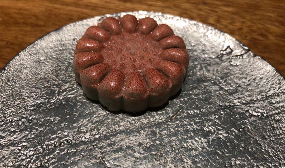 Photogallery






The sign appearing on Soi Langsuan in Bangkok, the little road where you can find restaurant Gaggan and, in front of it, the new-born Gaa, same ownership









The entrance to the restaurant, which recently got the second Michelin star. It’s open only in the evening. There are 65 people here who serve 100 clients daily, divided into two shifts (photo from themalaymailonline.com)









Gaggan’s famous emoji menu: "We first create the dish, then we sum it up with an emoji", he points out (photo from Andershusa/Instagram)









1 
Pink elderflower and watermelon
The tasting menu starts with the notes of the Foo Fighters. The entire first part of the menu is to be eaten with your hands: "This is how it works in India", he explains. First dish: a pearl among elderberry flowers and watermelon in an edible oyster shell. A debut to rinse the palate









2
Yogurt Explosion
Gaggan’s most famous dish. It’s the result of his early internship at elBulli in Roses, Catalonia. "If Ferran Adrià has had Spanish people accept a spherified olives", he says, "why shouldn’t I do the same with an emblem of India?". The spherified yogurt is made with low fat yogurt dipped in a sodium alginate









3
Lick it up. Mushroom peas
With "Lick it up", a hit from the Eighties by Kiss playing in the background, they serve this dish which you must hold with both hands and lick. The sauces, from bottom to top, in "licking order ": tomato, dehydrated mushrooms and mashed green chickpeas. On top, shaved truffle.  "Music, words, food. This is how we represent lightness"









Gaggan holds a cone









4
Tom Yum Kung
This is his version of Tom Yam (or Yum), a popular Thai soup. It’s a cold purée of tom yam served in crispy rice paper with a head of scampi to add flavour. It’s a sort of prawn cocktail in the shape of a cone









5
Goat brain, flower power
A cracker of goat brain ("to us Indians, it’s like foie gras", beams Gaggan) and rice flour. It is served to women first, playing with the similar sounds of flour and flower









6
Eggplant cookie
A cookie of aubergine, a sandwich the size of a coin, held together thanks to some onion chutney. "Out of 20, in Asia ingredients are usually worth 5, technique 15. With this dish I wanted to go in the opposite direction, return to Western minimalism with a universal emblem, that is to say aubergines. It’s a recent dish, which portraits the restaurant as it is now"









7
Chilly bon bon
Chilli pepper spheres. "Chocolates" filled with cumin, chilli pepper, ginger, and other spices. "In India there are four degrees of spiciness: hot, hotter, very hot and hell". The bon bon was mildly hot









8
Idly Sambar
Idly Sambar is a Tamil recipe, from the south of India: vegetable stew, tamarind and varying spices. "The world can be divided into two: those who eat rice, and those who eat bread. In this case, the base is bread made of fermented rice"









9
Banana chicken liver
"My daughter is one year and a half old. She’s difficult when it comes to eating. Give this combination to your children and they’ll be happy"









10
Fish Granola
Granola with fried seabass, walnuts and cheese cream









11
Gin tonic cucumber uni
Sea urchin cones, temaki, key lime and Indian tonic water. "This dish is the result of my trips to Japan: I went there 74 times only in the last couple of years. It has sea urchins from Hokkaido, in the north. In India we never eat raw food". The nori seaweed is made with dill









The selection of sea urchins from Hokkaido. "It’s worth its weight in gold", sighs Gaggan









12
Chutoro sushi
This is Gaggan’s homage to Tuna nigiri, an emblem of his future homeland (in 2021 after closing in Bangkok he’ll open a completely different restaurant in Fukuoka, Japan). Chutoro is a medium-fat tuna. In this case it is caramelised, adding a little emulsion of yuzu on top. The interesting part is below: it’s not rice, but a meringue made of all the ingredients used in sushi, that is to say vinegar, rice, sugar. "Sushi is a one way trip. You’ll never return. Nobody told me how to make it. This dish is a new take on a very personal memory"









13
Foie gras yuzu carrot
Carrot tartelette filled with foie gras. There’s no sweat on the hand: before the tasting they spray yuzu on the palm









Recipe number 14, another excursus between Japan and India









The dish is finished at the table









Whisking the mixture









14
Green vegetable matcha
Green apple gazpacho, cucumber and matcha tea. "I first fell in love with Japan thanks to tea. This looks like Japan but tastes of India and represents Gaggan"









15
Pork Vindaloo 
Vindaloo is a recipe from Goa, the Portuguese feud in west India. It’s pork, seasoned with garlic, vinegar and hot chilli pepper. In this case the fried texture is super-crispy, enriched with Japanese mustard which gives value to the Iberian pig marinated in wine and spices









New dishing out at the Chef's Table









16
Scallop uncooked curry
Scallops with green chilli, fried shallot and coconut ice cream. A “fake-curry ". The dish is served with a complaint about the past: "It’s the British who brought curry. It’s not part of our heritage, just like Chicken tikka masala. For me curry is a universal flavour, suitable for everything"









You can enrich the curry with two chilli sauces: the green, sweeter one (make love) or the red hot one (sex). "I come front the country that invented Kamasutra"









17
Sheek Kebab
A mini-sausage that’s a new take on a great Indian classic, sheek kebab. "The sausage is a clear proof of the huge influence that Chinese and Indian cuisine have had on the West. I bought this one from the market, today, and added galang and ginger. (In the photo, you can see the vegetarian version to the right)









18
Thai Green Curry
A crispy wafer made with dehydrated chicken skin with coriander sauce, in a miniaturised version of the traditional Thai green curry. In this case too, the version on the right is vegetarian









Gaggan gets a torch and starts to caramelise the banana leaves









The banana leaf is burning...









19
Seabass Bengali Mustard
...inside there’s a filet of smoked sea bass with mildly hot Bengali mustard. "It’s my oldest recipe, which is based on the ancestral gesture of man discovering fire. Before I die, I want to eat this"









20
Charcoal lotus stem
Fried aubergine with a stalk of lotus inside. It’s a total black fried snack, which looks similar to charcoal









21
Lobster dosa
Dosa (rice batter) with open lobster, in Indian sauce. You have to close it and eat it like a taco
 









The quotation of Stéphane Mallarmé









22
Beetroot rose
Beetroot rose with Tonka bean. A pre-dessert. "Kiss from a rose" by Seal starts in the background






