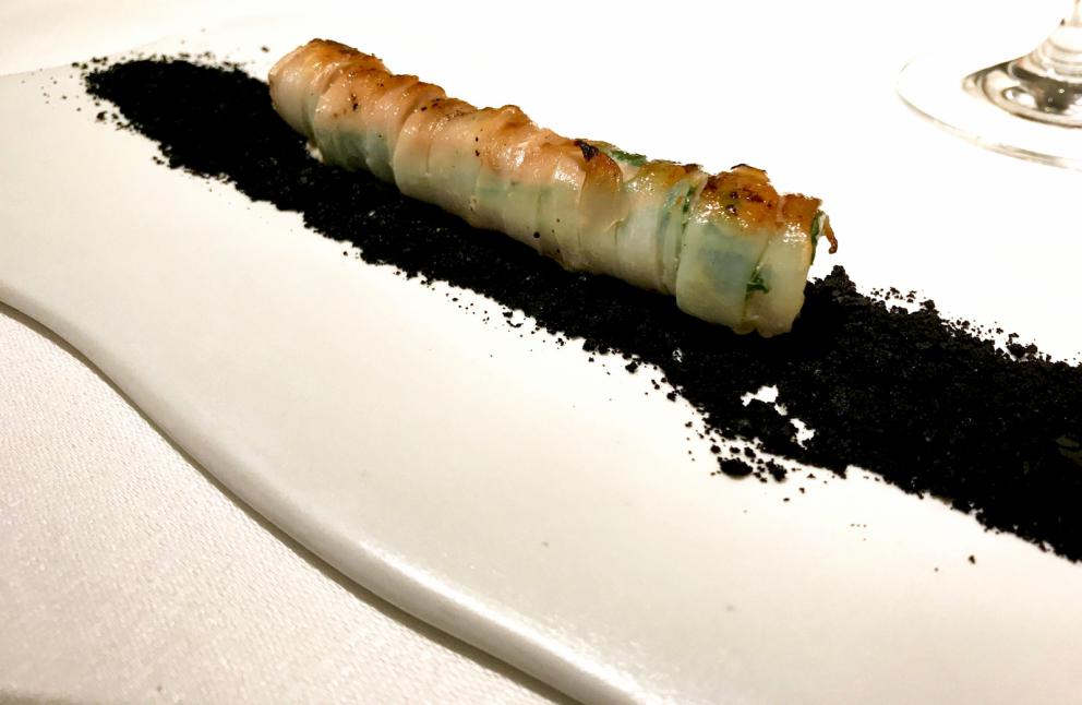 Galleria fotografica






Si inizia con una degustazione di crudi di mare e oli: lo scampo con sale delle Hawaii e olio al mandarino, i gamberetti con sale rosa dell'Himalaya e olio al limone, il gambero rosso con sale blu di Persia e olio all'arancia, lo scorfano con fior di sale e olio all'alloro, il San Pietro con sale Maldon e olio alla carruba, il tonno con sale di Trapani e olio affumicato, il calamaro con sale nero delle Hawaii e olio alla cenere









Da sottolineare anche i pani, a base di antichi grani siciliani: la pagnotta è fatta con farina di Tumminia, i cracker di Perciasacchi, i grissini con un blend di Russello e Perciasacchi









Arrascaturi: gamberi di nassa crudi vengono conditi con il residuo nel tegame delle panelle, poi sale nero delle Hawaii, ricci di mare, erbette aromatiche. Così gustoso che ci siamo dimenticati di fotografarlo, lo scatto è di Stefania Petrotta









Scampo d'estate: lo scampo scottato, pomodoro liquido, poi una versione 2.0 del tradizionale canazzo siciliano di verdure (uno stufato vegetale misto), granite d'acciughe e foglie di cappero. Buonissimo e molto bello









Gambero rosso nella sua nassa: la finta nassa è fatta di patate aromatizzate con la barbabietola, la salsa di pane e zenzero in agrodolce, poi estratto di carota, colatura di alici e habanero. Altro must









Cialda di carota di Ispica, tartare di Cinisara, spuma di bufala ragusana, salsa di caciocavallo, crema di porcini. Delizioso









Viaggio in India: puri (il pane indiano fritto), spuma di patate, maialino nero dei Nebrodi, tonno rosso, spezie indiane (cardamomo, coriandolo, cumino e peperoncino). E' un omaggio a un Paese e a una cucina che Lo Coco ha conosciuto e amato durante un viaggio di circa un anno fa o poco meno









Anelletti al forno, piatto presentato da Lo Coco a Identità Milano 2017, qui la ricetta. Golosissimo









Piatto di classe, molto moderno: Seppia, crema di patate, pane fresco con limone Verdello, nero di seppia, foglie di alga fritte






