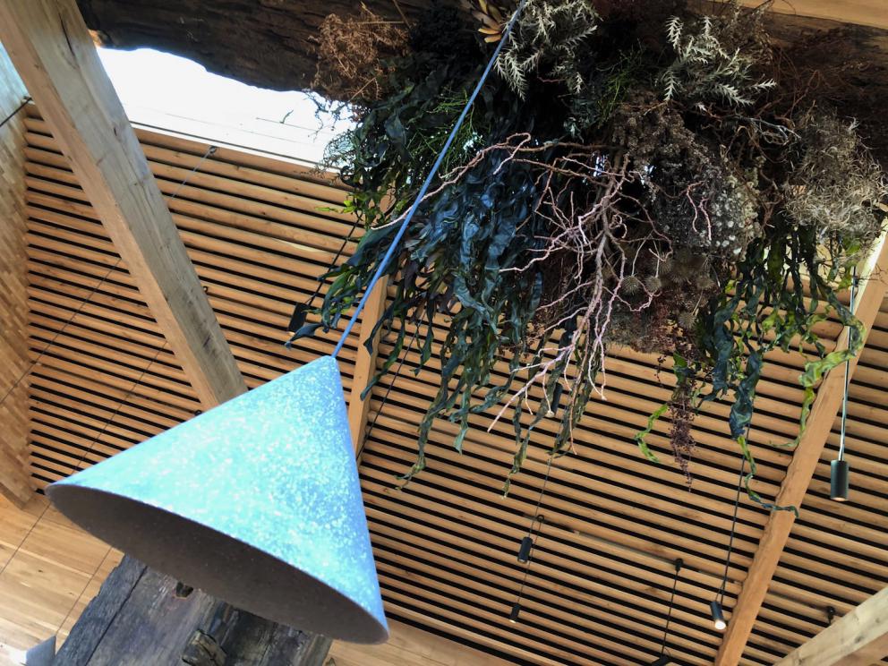 Photogallery






Noma 2.0 is in Christianshavn, the same neighbourhood as the first Noma. They’re 1.5 km apart, a 15 minutes’ walk. This picture shows the distance: to the right, there’s the warehouse of the old location (in Strandgade 93), to the left the smokestacks of Amager Bakke, the futuristic incinerator below which stands the new Noma (in Refshalevej 96)









Weather permitting, you can have a peaceful walk between the previous Noma to today’s Noma 









The new Noma is on an isthmus surrounded by canals. In the future they also want to reclaim some small parts for hydroponic farming









Bucolic scene with incinerator









Bikes left outside Noma. It’s the favourite means of transport among employees and interns









The long path taking you to the restaurant. The fence on the left shows how works are still in progress









On the two sides of the path there are the two new sections of the "Noma village", each with its specialty: grill, hot dishes, snacks, fermentations... In one month’s time, behind the fence we’ll have greenhouses, the test kitchen and the bread making area









To the left, before arriving at the restaurant, the future test kitchen. This will be run by Danish Mette Søberg with Riccardo Canella. "My first challenge?", reveals the latter, for a long time sous chef here, "is to work on the extraction of essential oils" 









The future Test Kitchen









The temporary gangway to the restaurant









Looking from the door to the restaurant, there’s a lake and the smokestacks puffing vapour from the Amager Bakke incinerator. It’s a futuristic project, both in terms of sustainability and architecture. It’s also known as Amager Slope or Copenhill, and its author is starchitect Bjarke Ingels, the same who designed the new Noma. Gradually opened in 2017, it transforms waste into electricity. The goal is to donate electricity to 62500 houses and hot water to 160000. It’s part of an ambitious project to transform Copenhagen into the first city in the world in terms of zero carbon dioxide emissions by 2025. By autumn this year, Amager Slope should open its ski slope, a climbing wall and a hiking track. You’ll be able to slalom on top of the incinerator









The windows from the dining room









Work is still in progress (photo taken on Thursday 22nd February 2018)









Traces of the old building, with barbwire. During WWII, they built bombs here









A view of the dining room at night (photo from Instagram/James Spreadbury)









The entrance to the restaurant









The usual ritual: a welcome from the entire staff, led by Rene Redzepi 









Behind the entrance, there are formaldehyde tanks with creatures from the abyss, shaped as in Damien Hirst’s works. The first image once you’re inside is to reproduce a Scandinavian village









The service kitchen is larger, more spacious and a completely open view from the dining room: "It’s the heart of our Scandinavian village", says Canella. There are 30 cooks working here now. 10 more, compared to the previous Noma









Large skylights above the cooks









There are currently more than 100 people working at Noma, of whom 63 are cooks - 26 employed, and 37 as interns









There’s fire in the kitchen, for the first time









On average, the dining room can host 40 people. "However", complains Redzepi, "there’s always someone who turns up with more people than the ones booked"









While the dining room is set, the outside space still need to be defined









The staff made the dining room decorations. There are no overly expensive designer objects









Dried fish






