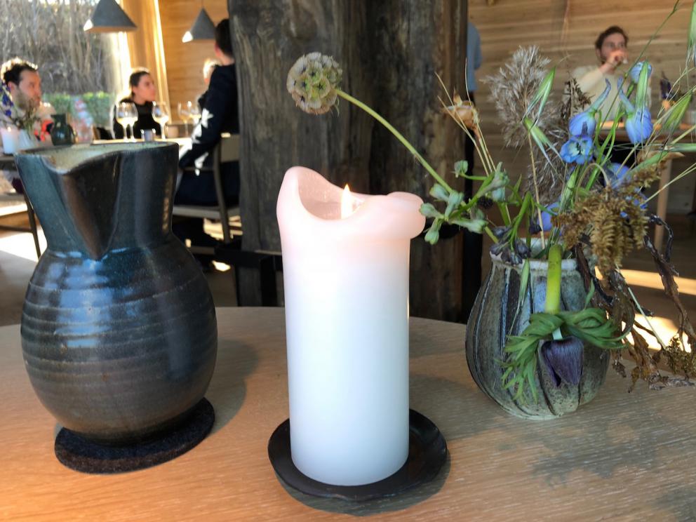 Photogallery






Noma 2.0 is in Christianshavn, the same neighbourhood as the first Noma. They’re 1.5 km apart, a 15 minutes’ walk. This picture shows the distance: to the right, there’s the warehouse of the old location (in Strandgade 93), to the left the smokestacks of Amager Bakke, the futuristic incinerator below which stands the new Noma (in Refshalevej 96)









Weather permitting, you can have a peaceful walk between the previous Noma to today’s Noma 









The new Noma is on an isthmus surrounded by canals. In the future they also want to reclaim some small parts for hydroponic farming









Bucolic scene with incinerator









Bikes left outside Noma. It’s the favourite means of transport among employees and interns









The long path taking you to the restaurant. The fence on the left shows how works are still in progress









On the two sides of the path there are the two new sections of the "Noma village", each with its specialty: grill, hot dishes, snacks, fermentations... In one month’s time, behind the fence we’ll have greenhouses, the test kitchen and the bread making area









To the left, before arriving at the restaurant, the future test kitchen. This will be run by Danish Mette Søberg with Riccardo Canella. "My first challenge?", reveals the latter, for a long time sous chef here, "is to work on the extraction of essential oils" 









The future Test Kitchen









The temporary gangway to the restaurant









Looking from the door to the restaurant, there’s a lake and the smokestacks puffing vapour from the Amager Bakke incinerator. It’s a futuristic project, both in terms of sustainability and architecture. It’s also known as Amager Slope or Copenhill, and its author is starchitect Bjarke Ingels, the same who designed the new Noma. Gradually opened in 2017, it transforms waste into electricity. The goal is to donate electricity to 62500 houses and hot water to 160000. It’s part of an ambitious project to transform Copenhagen into the first city in the world in terms of zero carbon dioxide emissions by 2025. By autumn this year, Amager Slope should open its ski slope, a climbing wall and a hiking track. You’ll be able to slalom on top of the incinerator









The windows from the dining room









Work is still in progress (photo taken on Thursday 22nd February 2018)









Traces of the old building, with barbwire. During WWII, they built bombs here









A view of the dining room at night (photo from Instagram/James Spreadbury)









The entrance to the restaurant









The usual ritual: a welcome from the entire staff, led by Rene Redzepi 









Behind the entrance, there are formaldehyde tanks with creatures from the abyss, shaped as in Damien Hirst’s works. The first image once you’re inside is to reproduce a Scandinavian village









The service kitchen is larger, more spacious and a completely open view from the dining room: "It’s the heart of our Scandinavian village", says Canella. There are 30 cooks working here now. 10 more, compared to the previous Noma









Large skylights above the cooks









There are currently more than 100 people working at Noma, of whom 63 are cooks - 26 employed, and 37 as interns









There’s fire in the kitchen, for the first time









On average, the dining room can host 40 people. "However", complains Redzepi, "there’s always someone who turns up with more people than the ones booked"









While the dining room is set, the outside space still need to be defined









The staff made the dining room decorations. There are no overly expensive designer objects









Dried fish









Seaweeds hanging from the ceiling









Dried octopus heads preserved in salt (with a balloon inside)














Bjarke Ingels and Redzepi’s plan included the wish to recreate a Danish farm









The luminous private dining room









The counter in the dining room. They drew the beams from the canals around the restaurant














The mise en place, bare and strictly without tablecloths






