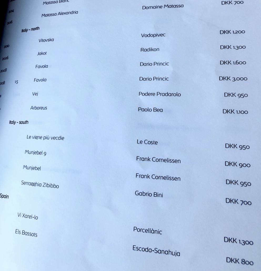 Photogallery






Noma 2.0 is in Christianshavn, the same neighbourhood as the first Noma. They’re 1.5 km apart, a 15 minutes’ walk. This picture shows the distance: to the right, there’s the warehouse of the old location (in Strandgade 93), to the left the smokestacks of Amager Bakke, the futuristic incinerator below which stands the new Noma (in Refshalevej 96)









Weather permitting, you can have a peaceful walk between the previous Noma to today’s Noma 









The new Noma is on an isthmus surrounded by canals. In the future they also want to reclaim some small parts for hydroponic farming









Bucolic scene with incinerator









Bikes left outside Noma. It’s the favourite means of transport among employees and interns









The long path taking you to the restaurant. The fence on the left shows how works are still in progress









On the two sides of the path there are the two new sections of the "Noma village", each with its specialty: grill, hot dishes, snacks, fermentations... In one month’s time, behind the fence we’ll have greenhouses, the test kitchen and the bread making area









To the left, before arriving at the restaurant, the future test kitchen. This will be run by Danish Mette Søberg with Riccardo Canella. "My first challenge?", reveals the latter, for a long time sous chef here, "is to work on the extraction of essential oils" 









The future Test Kitchen









The temporary gangway to the restaurant









Looking from the door to the restaurant, there’s a lake and the smokestacks puffing vapour from the Amager Bakke incinerator. It’s a futuristic project, both in terms of sustainability and architecture. It’s also known as Amager Slope or Copenhill, and its author is starchitect Bjarke Ingels, the same who designed the new Noma. Gradually opened in 2017, it transforms waste into electricity. The goal is to donate electricity to 62500 houses and hot water to 160000. It’s part of an ambitious project to transform Copenhagen into the first city in the world in terms of zero carbon dioxide emissions by 2025. By autumn this year, Amager Slope should open its ski slope, a climbing wall and a hiking track. You’ll be able to slalom on top of the incinerator









The windows from the dining room









Work is still in progress (photo taken on Thursday 22nd February 2018)









Traces of the old building, with barbwire. During WWII, they built bombs here









A view of the dining room at night (photo from Instagram/James Spreadbury)









The entrance to the restaurant









The usual ritual: a welcome from the entire staff, led by Rene Redzepi 









Behind the entrance, there are formaldehyde tanks with creatures from the abyss, shaped as in Damien Hirst’s works. The first image once you’re inside is to reproduce a Scandinavian village









The service kitchen is larger, more spacious and a completely open view from the dining room: "It’s the heart of our Scandinavian village", says Canella. There are 30 cooks working here now. 10 more, compared to the previous Noma









Large skylights above the cooks









There are currently more than 100 people working at Noma, of whom 63 are cooks - 26 employed, and 37 as interns









There’s fire in the kitchen, for the first time









On average, the dining room can host 40 people. "However", complains Redzepi, "there’s always someone who turns up with more people than the ones booked"









While the dining room is set, the outside space still need to be defined









The staff made the dining room decorations. There are no overly expensive designer objects









Dried fish









Seaweeds hanging from the ceiling









Dried octopus heads preserved in salt (with a balloon inside)














Bjarke Ingels and Redzepi’s plan included the wish to recreate a Danish farm









The luminous private dining room









The counter in the dining room. They drew the beams from the canals around the restaurant














The mise en place, bare and strictly without tablecloths









Water jug, candle, flower vase









A warm cloth, to begin with









Australian James Spreadbury, restaurant manager and partner at Noma









Welcome drink: Champagne extra brut Blanc d'Argile from Domaine Vouette et Sorbée









Sea Snail broth. The welcome dish at Noma is, as usual, a hot “soup”









Stefano Ferrano, from Torino, presents the following dish. There’s always a large Italian colony at Noma









Venus clams. Molluscs from Limfjord (Denmark) mixed with decorative clams, typical of Noma. Beside them, shells with blackcurrant oil and “Danish curry”, made with toasted coriander seeds, fennel and fennel seeds









The lid above the following dish. The mussels are not edible









Best of the mussel. Mussels open in a pan with water of fermented barley. «We recreate the mussel», says Canella, «using just the flaps, the best part». The paste is made with scraps from the mussel, cooked in smoked butter









The next dish is conceived and served by Riccardo Canella, the Paduan sous chef who conquered Redzepi, here with dining room intern Feline Hansen









Dried fruits and shrimps. In this case, the heads are not a decoration, but you must suck them –best not eat them because of the bones: they’re filled with a lovely prawn cream. The small crustaceans are still alive when they arrive on a ship straight from the Norwegian fjords









Inside, under the prawn broth skin, there’s fruits and vegetable preserved from the previous summer with raw prawns and gooseberry sauce with blackcurrant oil









How about beverages? There are three options, as usual: wine pairing (6 glasses plus a beer plus sake, 150 euros), juice pairing (juices and extracts, 110 euros) or a choice from the list. They recommend Champagne Chut... Libre from Val'Frison pour Dominique Derain, 50% Pinot Noir, 50% Chardonnay created by a couple who met at the old Noma. Well bodied, it will be a good match throughout the meal









As usual, the wine list starts with Champagne: the cheapest is 1400 crowns (190 euros)









White wines begin with labels from cold climates: first Austria, increasingly popular for its natural wines, then Germany, then all the others






