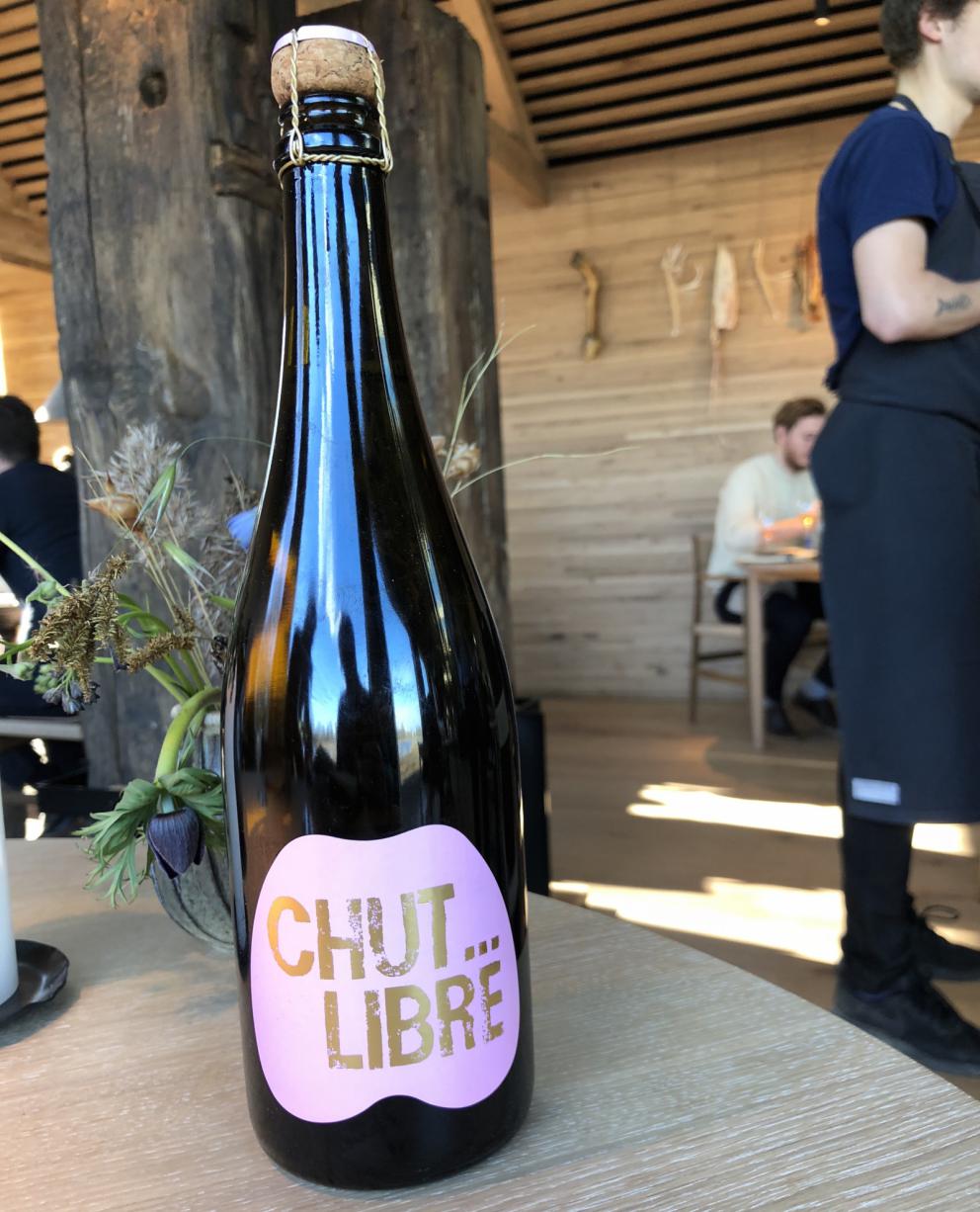 Photogallery






Noma 2.0 is in Christianshavn, the same neighbourhood as the first Noma. They’re 1.5 km apart, a 15 minutes’ walk. This picture shows the distance: to the right, there’s the warehouse of the old location (in Strandgade 93), to the left the smokestacks of Amager Bakke, the futuristic incinerator below which stands the new Noma (in Refshalevej 96)









Weather permitting, you can have a peaceful walk between the previous Noma to today’s Noma 









The new Noma is on an isthmus surrounded by canals. In the future they also want to reclaim some small parts for hydroponic farming









Bucolic scene with incinerator









Bikes left outside Noma. It’s the favourite means of transport among employees and interns









The long path taking you to the restaurant. The fence on the left shows how works are still in progress









On the two sides of the path there are the two new sections of the "Noma village", each with its specialty: grill, hot dishes, snacks, fermentations... In one month’s time, behind the fence we’ll have greenhouses, the test kitchen and the bread making area









To the left, before arriving at the restaurant, the future test kitchen. This will be run by Danish Mette Søberg with Riccardo Canella. "My first challenge?", reveals the latter, for a long time sous chef here, "is to work on the extraction of essential oils" 









The future Test Kitchen









The temporary gangway to the restaurant









Looking from the door to the restaurant, there’s a lake and the smokestacks puffing vapour from the Amager Bakke incinerator. It’s a futuristic project, both in terms of sustainability and architecture. It’s also known as Amager Slope or Copenhill, and its author is starchitect Bjarke Ingels, the same who designed the new Noma. Gradually opened in 2017, it transforms waste into electricity. The goal is to donate electricity to 62500 houses and hot water to 160000. It’s part of an ambitious project to transform Copenhagen into the first city in the world in terms of zero carbon dioxide emissions by 2025. By autumn this year, Amager Slope should open its ski slope, a climbing wall and a hiking track. You’ll be able to slalom on top of the incinerator









The windows from the dining room









Work is still in progress (photo taken on Thursday 22nd February 2018)









Traces of the old building, with barbwire. During WWII, they built bombs here









A view of the dining room at night (photo from Instagram/James Spreadbury)









The entrance to the restaurant









The usual ritual: a welcome from the entire staff, led by Rene Redzepi 









Behind the entrance, there are formaldehyde tanks with creatures from the abyss, shaped as in Damien Hirst’s works. The first image once you’re inside is to reproduce a Scandinavian village









The service kitchen is larger, more spacious and a completely open view from the dining room: "It’s the heart of our Scandinavian village", says Canella. There are 30 cooks working here now. 10 more, compared to the previous Noma









Large skylights above the cooks









There are currently more than 100 people working at Noma, of whom 63 are cooks - 26 employed, and 37 as interns









There’s fire in the kitchen, for the first time









On average, the dining room can host 40 people. "However", complains Redzepi, "there’s always someone who turns up with more people than the ones booked"









While the dining room is set, the outside space still need to be defined









The staff made the dining room decorations. There are no overly expensive designer objects









Dried fish









Seaweeds hanging from the ceiling









Dried octopus heads preserved in salt (with a balloon inside)














Bjarke Ingels and Redzepi’s plan included the wish to recreate a Danish farm









The luminous private dining room









The counter in the dining room. They drew the beams from the canals around the restaurant














The mise en place, bare and strictly without tablecloths









Water jug, candle, flower vase









A warm cloth, to begin with









Australian James Spreadbury, restaurant manager and partner at Noma









Welcome drink: Champagne extra brut Blanc d'Argile from Domaine Vouette et Sorbée









Sea Snail broth. The welcome dish at Noma is, as usual, a hot “soup”









Stefano Ferrano, from Torino, presents the following dish. There’s always a large Italian colony at Noma









Venus clams. Molluscs from Limfjord (Denmark) mixed with decorative clams, typical of Noma. Beside them, shells with blackcurrant oil and “Danish curry”, made with toasted coriander seeds, fennel and fennel seeds









The lid above the following dish. The mussels are not edible









Best of the mussel. Mussels open in a pan with water of fermented barley. «We recreate the mussel», says Canella, «using just the flaps, the best part». The paste is made with scraps from the mussel, cooked in smoked butter









The next dish is conceived and served by Riccardo Canella, the Paduan sous chef who conquered Redzepi, here with dining room intern Feline Hansen









Dried fruits and shrimps. In this case, the heads are not a decoration, but you must suck them –best not eat them because of the bones: they’re filled with a lovely prawn cream. The small crustaceans are still alive when they arrive on a ship straight from the Norwegian fjords









Inside, under the prawn broth skin, there’s fruits and vegetable preserved from the previous summer with raw prawns and gooseberry sauce with blackcurrant oil






