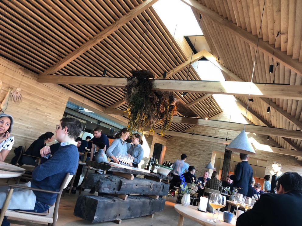 Photogallery






Noma 2.0 is in Christianshavn, the same neighbourhood as the first Noma. They’re 1.5 km apart, a 15 minutes’ walk. This picture shows the distance: to the right, there’s the warehouse of the old location (in Strandgade 93), to the left the smokestacks of Amager Bakke, the futuristic incinerator below which stands the new Noma (in Refshalevej 96)









Weather permitting, you can have a peaceful walk between the previous Noma to today’s Noma 









The new Noma is on an isthmus surrounded by canals. In the future they also want to reclaim some small parts for hydroponic farming









Bucolic scene with incinerator









Bikes left outside Noma. It’s the favourite means of transport among employees and interns









The long path taking you to the restaurant. The fence on the left shows how works are still in progress









On the two sides of the path there are the two new sections of the "Noma village", each with its specialty: grill, hot dishes, snacks, fermentations... In one month’s time, behind the fence we’ll have greenhouses, the test kitchen and the bread making area









To the left, before arriving at the restaurant, the future test kitchen. This will be run by Danish Mette Søberg with Riccardo Canella. "My first challenge?", reveals the latter, for a long time sous chef here, "is to work on the extraction of essential oils" 









The future Test Kitchen









The temporary gangway to the restaurant









Looking from the door to the restaurant, there’s a lake and the smokestacks puffing vapour from the Amager Bakke incinerator. It’s a futuristic project, both in terms of sustainability and architecture. It’s also known as Amager Slope or Copenhill, and its author is starchitect Bjarke Ingels, the same who designed the new Noma. Gradually opened in 2017, it transforms waste into electricity. The goal is to donate electricity to 62500 houses and hot water to 160000. It’s part of an ambitious project to transform Copenhagen into the first city in the world in terms of zero carbon dioxide emissions by 2025. By autumn this year, Amager Slope should open its ski slope, a climbing wall and a hiking track. You’ll be able to slalom on top of the incinerator









The windows from the dining room









Work is still in progress (photo taken on Thursday 22nd February 2018)









Traces of the old building, with barbwire. During WWII, they built bombs here









A view of the dining room at night (photo from Instagram/James Spreadbury)









The entrance to the restaurant









The usual ritual: a welcome from the entire staff, led by Rene Redzepi 









Behind the entrance, there are formaldehyde tanks with creatures from the abyss, shaped as in Damien Hirst’s works. The first image once you’re inside is to reproduce a Scandinavian village









The service kitchen is larger, more spacious and a completely open view from the dining room: "It’s the heart of our Scandinavian village", says Canella. There are 30 cooks working here now. 10 more, compared to the previous Noma









Large skylights above the cooks









There are currently more than 100 people working at Noma, of whom 63 are cooks - 26 employed, and 37 as interns









There’s fire in the kitchen, for the first time









On average, the dining room can host 40 people. "However", complains Redzepi, "there’s always someone who turns up with more people than the ones booked"









While the dining room is set, the outside space still need to be defined









The staff made the dining room decorations. There are no overly expensive designer objects









Dried fish









Seaweeds hanging from the ceiling









Dried octopus heads preserved in salt (with a balloon inside)











