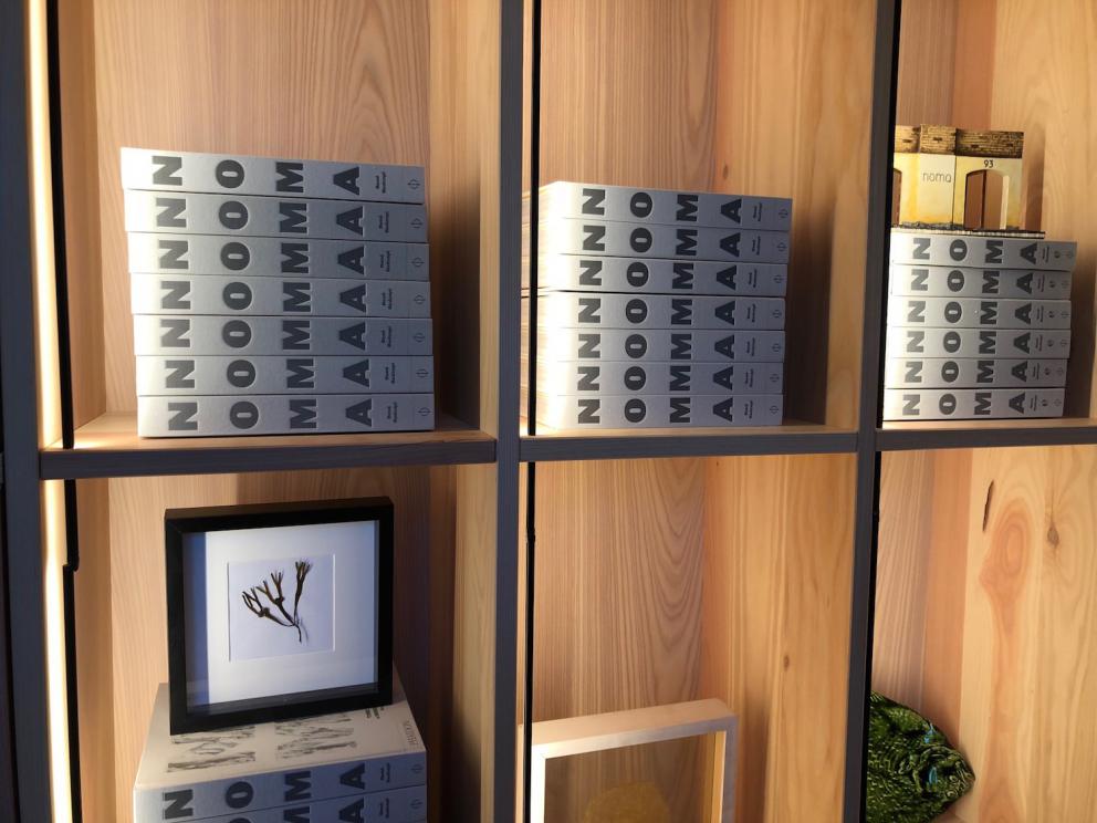 Photogallery






Noma 2.0 is in Christianshavn, the same neighbourhood as the first Noma. They’re 1.5 km apart, a 15 minutes’ walk. This picture shows the distance: to the right, there’s the warehouse of the old location (in Strandgade 93), to the left the smokestacks of Amager Bakke, the futuristic incinerator below which stands the new Noma (in Refshalevej 96)









Weather permitting, you can have a peaceful walk between the previous Noma to today’s Noma 









The new Noma is on an isthmus surrounded by canals. In the future they also want to reclaim some small parts for hydroponic farming









Bucolic scene with incinerator









Bikes left outside Noma. It’s the favourite means of transport among employees and interns









The long path taking you to the restaurant. The fence on the left shows how works are still in progress









On the two sides of the path there are the two new sections of the "Noma village", each with its specialty: grill, hot dishes, snacks, fermentations... In one month’s time, behind the fence we’ll have greenhouses, the test kitchen and the bread making area









To the left, before arriving at the restaurant, the future test kitchen. This will be run by Danish Mette Søberg with Riccardo Canella. "My first challenge?", reveals the latter, for a long time sous chef here, "is to work on the extraction of essential oils" 









The future Test Kitchen









The temporary gangway to the restaurant









Looking from the door to the restaurant, there’s a lake and the smokestacks puffing vapour from the Amager Bakke incinerator. It’s a futuristic project, both in terms of sustainability and architecture. It’s also known as Amager Slope or Copenhill, and its author is starchitect Bjarke Ingels, the same who designed the new Noma. Gradually opened in 2017, it transforms waste into electricity. The goal is to donate electricity to 62500 houses and hot water to 160000. It’s part of an ambitious project to transform Copenhagen into the first city in the world in terms of zero carbon dioxide emissions by 2025. By autumn this year, Amager Slope should open its ski slope, a climbing wall and a hiking track. You’ll be able to slalom on top of the incinerator









The windows from the dining room









Work is still in progress (photo taken on Thursday 22nd February 2018)









Traces of the old building, with barbwire. During WWII, they built bombs here









A view of the dining room at night (photo from Instagram/James Spreadbury)









The entrance to the restaurant









The usual ritual: a welcome from the entire staff, led by Rene Redzepi 









Behind the entrance, there are formaldehyde tanks with creatures from the abyss, shaped as in Damien Hirst’s works. The first image once you’re inside is to reproduce a Scandinavian village









The service kitchen is larger, more spacious and a completely open view from the dining room: "It’s the heart of our Scandinavian village", says Canella. There are 30 cooks working here now. 10 more, compared to the previous Noma









Large skylights above the cooks









There are currently more than 100 people working at Noma, of whom 63 are cooks - 26 employed, and 37 as interns









There’s fire in the kitchen, for the first time









On average, the dining room can host 40 people. "However", complains Redzepi, "there’s always someone who turns up with more people than the ones booked"









While the dining room is set, the outside space still need to be defined









The staff made the dining room decorations. There are no overly expensive designer objects









Dried fish









Seaweeds hanging from the ceiling









Dried octopus heads preserved in salt (with a balloon inside)














Bjarke Ingels and Redzepi’s plan included the wish to recreate a Danish farm









The luminous private dining room









The counter in the dining room. They drew the beams from the canals around the restaurant














The mise en place, bare and strictly without tablecloths









Water jug, candle, flower vase









A warm cloth, to begin with









Australian James Spreadbury, restaurant manager and partner at Noma









Welcome drink: Champagne extra brut Blanc d'Argile from Domaine Vouette et Sorbée









Sea Snail broth. The welcome dish at Noma is, as usual, a hot “soup”









Stefano Ferrano, from Torino, presents the following dish. There’s always a large Italian colony at Noma









Venus clams. Molluscs from Limfjord (Denmark) mixed with decorative clams, typical of Noma. Beside them, shells with blackcurrant oil and “Danish curry”, made with toasted coriander seeds, fennel and fennel seeds









The lid above the following dish. The mussels are not edible









Best of the mussel. Mussels open in a pan with water of fermented barley. «We recreate the mussel», says Canella, «using just the flaps, the best part». The paste is made with scraps from the mussel, cooked in smoked butter









The next dish is conceived and served by Riccardo Canella, the Paduan sous chef who conquered Redzepi, here with dining room intern Feline Hansen









Dried fruits and shrimps. In this case, the heads are not a decoration, but you must suck them –best not eat them because of the bones: they’re filled with a lovely prawn cream. The small crustaceans are still alive when they arrive on a ship straight from the Norwegian fjords









Inside, under the prawn broth skin, there’s fruits and vegetable preserved from the previous summer with raw prawns and gooseberry sauce with blackcurrant oil









How about beverages? There are three options, as usual: wine pairing (6 glasses plus a beer plus sake, 150 euros), juice pairing (juices and extracts, 110 euros) or a choice from the list. They recommend Champagne Chut... Libre from Val'Frison pour Dominique Derain, 50% Pinot Noir, 50% Chardonnay created by a couple who met at the old Noma. Well bodied, it will be a good match throughout the meal









As usual, the wine list starts with Champagne: the cheapest is 1400 crowns (190 euros)









White wines begin with labels from cold climates: first Austria, increasingly popular for its natural wines, then Germany, then all the others









How about Italy? Few names, among the white wines, from North and South









A dozen red/orange wines









Sea star, that is to say Cured trout roe and eggs, the emblem dish of this new era. They recommend moving the teaspoon from the heart to the edges of the tentacles. Aesthetics win over taste









Jellyfish. The jellyfish gel in the middle is in fact a clarified broth of calamari and recalls the texture of jellyfish. "We tried to cook jellyfish in 300 different ways but none was convincing so far". All around, pickled seaweed. The gel is almost tasteless, it serves to clean the palate after the pickles









Rene Redzepi himself presents the content of the first Seafood platter.









French style service with a small plate below for the empty shells









It’s made of two (per two) pieces: queen clam and mahogany clam









The Queen Clam is a very small variety of Norwegian scallop, seasoned with a vegetal reduction made with cucumber and peas miso. The red tip is the coral. "You should eat it using the top shell ", recommends Redzepi









The Mahogany clam is a centennial clam from the North Sea, very popular in Denmark and Iceland. «You can tell the age by the number of rings, like with trees», says Redzepi, «In 2007 they found one that was 450 years old. We’ve had it in the menu for a decade or so». The razor clam shell serves as teaspoon









Inside, there’s obviously not just a bare Mahogany. «We open it when the client arrives», says Canella, «remove the entrails and then slice it so as to preserve its firm texture». It’s seasoned with stir-fried gooseberry, capers of blackcurrants and blackcurrant sprouts preserved in vinegar. The sauce is made with mussel water









A note on the chairs: they’re more minimalistic. They’re no longer covered in sheepskin or leather from other Danish animals, in the style of Noma 1.0. The most significant element is the napkin: if you go to the toilet, they no longer replace it with a new one. There’s the old one, tied to the chair. "This is sustainability", they explain









The second seafood platter. It’s made of Sea cucumber and sour cream in various textures, including «chicharrones» (at 9 o’clock), sea urchins (at 12 and 3) and gigas oyster (at 6)









Sea urchins pressed in fresh cream and pumpkin seeds









Giga Oyster, a huge oyster from the Pacific, quickly steamed and garnished with pickles. Noma only reserved one thousand of these. In the menu until available









The following dish, off the menu, is again from Canella: horse mussel ragout, rare specimen of which 30 arrive at 'Noma each week









They cook the mussel as if it were kidney, in a sort of Bolognese sauce but with ginger. Ginger? "Yes, we’ve decided to include it, as with other spices, after our Mexican experience"









Another Italian presents a dish, Edoardo Fiaschi from Prato, at Noma for 3 years now









Squid in seaweed butter. An almost neglected Danish squid lightly seared in fermented koji oil, rolled and seasoned with seaweed butter and served on sticks of blackcurrant that widen its aromas. Formidable and beautiful









The following dish is inside a nice bee wax container. It’s made with balloons covered multiple times in bee wax. «We spent weeks making them. We’ve made thousands». They’re disposable...









Sea snail and roses. They recommend to: "Eat it keeping the bee wax on your hands "









Sea snail. Another small nibble from the top part of the sea snail, lightly warmed up in water and served on a reduction of lemon thyme









A sea snail toothpick, initially carved by Redzepi himself









Head of the cod, (right), the real main course at Noma









Another rather laborious recipe. «It takes half an hour just to separate the head. We remove the skin, the collagen, we cut mandibles, tongue, cheek and the part behind. We rinse it in water, spices, koji and cook it in the yakitori with a glaze of mushrooms and spiced fennel broth»









You can garnish the cod as you choose, with a paste of ants (top right corner), a slightly spicy emulsion of koji oil, water and horseradish sauce (left) and Danish curry (bottom)









On the side of the cod, there’s also wild garlic seasoned with smoked butter and roasted yeast. Intense flavour









Cod bones after the tasting









An interlocutory snack made of cod cheek









Pickled vegetables and arctic herbs. The only vegetable dish in the menu, marks the passage from savoury to sweet dishes. Between June and August 2018 the menu at Noma will be 100% vegetarian









Preparation time: half an hour! A challenge for the person making it









Mussels appear once again, a classic emblem









This time it’s a dessert in the shape of a small sandwich. Pear and roasted kelp ice cream 









Cloudberries and pinecones. A dessert that continues Redzepi’s saga of unsweet sweets: cloudberries, pinecones preserved in sugar, yogurt snow (by Italian Jessica Natali) and a sea snail made with cloudberry sorbet









Filtered coffee made with stolen kenyoti seeds farmed in Honduras by a Norwegian guy. Italian sommelier Francesca Niro tells us this story. «In Denmark», she says, «coffee is not a final act»









Sugar kelp tart. Tartelletta di alga kelp con pralinato di pino (sul modello di quello di mandorle, autore Canella), panna e crisp di ostrica









Sugar kelp tart. Jessica Natali, 23, from the March, has been at Noma for 4 years now









Natali introduces the last dish, Plankton cake









It’s Redzepi’s tribute to Andalusian chef Angel Leon, the chef who brought the abyss of the sea on fine dining tables. A final trivia fact at the end of the meal: we were never served bread, a historic strongpoint at Noma. "There’s no need for bread in this menu", said Redzepi









With Canella we walk the very long corridor that starts from the opposite side of the room, right after the entrance









It’s the rationalised and enlarged equivalent of the previous Noma’s first floor. Dozens of guys are making the pre-preparations









Canella with Ali Sonko, Noma’s famous kitchen hand from Gambia who then became partner









Sea cucumbers and huge Artic crabs swim in the water tanks














Ants on a shrimp, the emblem of Noma’s pop-up in Tokyo






