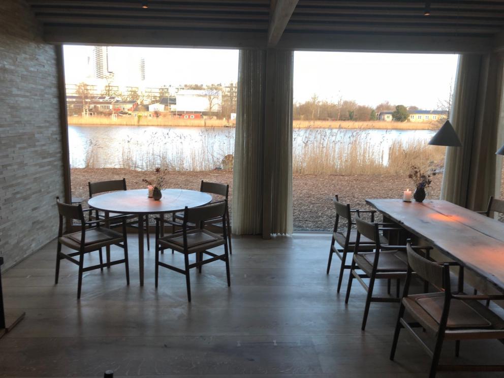 Photogallery






Noma 2.0 is in Christianshavn, the same neighbourhood as the first Noma. They’re 1.5 km apart, a 15 minutes’ walk. This picture shows the distance: to the right, there’s the warehouse of the old location (in Strandgade 93), to the left the smokestacks of Amager Bakke, the futuristic incinerator below which stands the new Noma (in Refshalevej 96)









Weather permitting, you can have a peaceful walk between the previous Noma to today’s Noma 









The new Noma is on an isthmus surrounded by canals. In the future they also want to reclaim some small parts for hydroponic farming









Bucolic scene with incinerator









Bikes left outside Noma. It’s the favourite means of transport among employees and interns









The long path taking you to the restaurant. The fence on the left shows how works are still in progress









On the two sides of the path there are the two new sections of the "Noma village", each with its specialty: grill, hot dishes, snacks, fermentations... In one month’s time, behind the fence we’ll have greenhouses, the test kitchen and the bread making area









To the left, before arriving at the restaurant, the future test kitchen. This will be run by Danish Mette Søberg with Riccardo Canella. "My first challenge?", reveals the latter, for a long time sous chef here, "is to work on the extraction of essential oils" 









The future Test Kitchen









The temporary gangway to the restaurant









Looking from the door to the restaurant, there’s a lake and the smokestacks puffing vapour from the Amager Bakke incinerator. It’s a futuristic project, both in terms of sustainability and architecture. It’s also known as Amager Slope or Copenhill, and its author is starchitect Bjarke Ingels, the same who designed the new Noma. Gradually opened in 2017, it transforms waste into electricity. The goal is to donate electricity to 62500 houses and hot water to 160000. It’s part of an ambitious project to transform Copenhagen into the first city in the world in terms of zero carbon dioxide emissions by 2025. By autumn this year, Amager Slope should open its ski slope, a climbing wall and a hiking track. You’ll be able to slalom on top of the incinerator









The windows from the dining room









Work is still in progress (photo taken on Thursday 22nd February 2018)









Traces of the old building, with barbwire. During WWII, they built bombs here









A view of the dining room at night (photo from Instagram/James Spreadbury)









The entrance to the restaurant









The usual ritual: a welcome from the entire staff, led by Rene Redzepi 









Behind the entrance, there are formaldehyde tanks with creatures from the abyss, shaped as in Damien Hirst’s works. The first image once you’re inside is to reproduce a Scandinavian village









The service kitchen is larger, more spacious and a completely open view from the dining room: "It’s the heart of our Scandinavian village", says Canella. There are 30 cooks working here now. 10 more, compared to the previous Noma









Large skylights above the cooks









There are currently more than 100 people working at Noma, of whom 63 are cooks - 26 employed, and 37 as interns









There’s fire in the kitchen, for the first time






