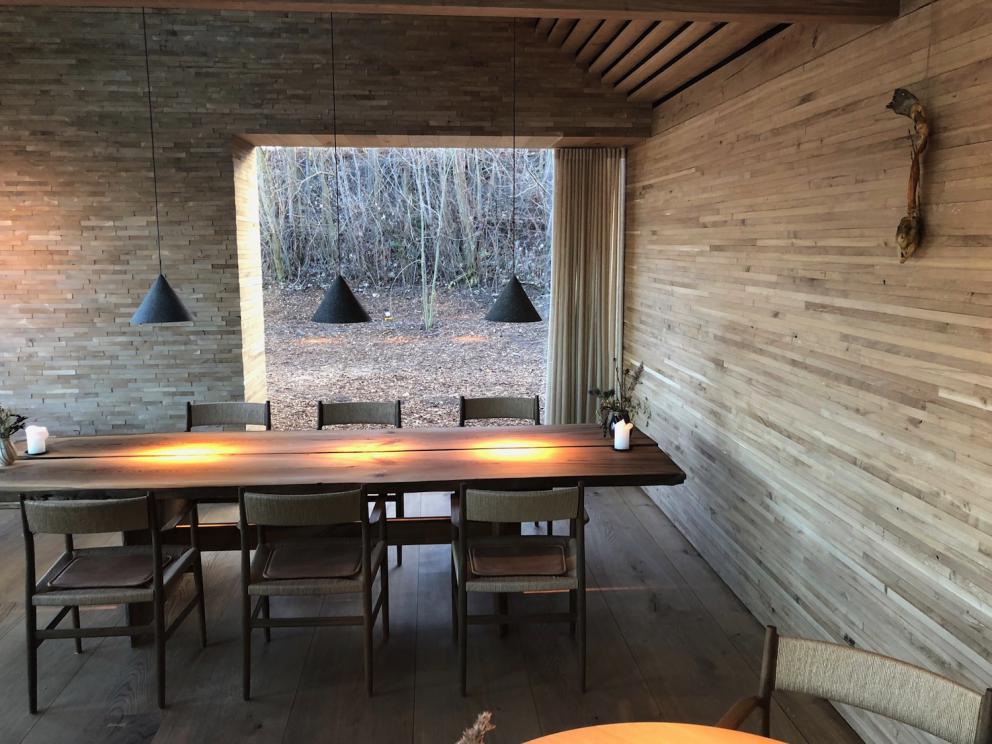 Photogallery






Noma 2.0 is in Christianshavn, the same neighbourhood as the first Noma. They’re 1.5 km apart, a 15 minutes’ walk. This picture shows the distance: to the right, there’s the warehouse of the old location (in Strandgade 93), to the left the smokestacks of Amager Bakke, the futuristic incinerator below which stands the new Noma (in Refshalevej 96)









Weather permitting, you can have a peaceful walk between the previous Noma to today’s Noma 









The new Noma is on an isthmus surrounded by canals. In the future they also want to reclaim some small parts for hydroponic farming









Bucolic scene with incinerator









Bikes left outside Noma. It’s the favourite means of transport among employees and interns









The long path taking you to the restaurant. The fence on the left shows how works are still in progress









On the two sides of the path there are the two new sections of the "Noma village", each with its specialty: grill, hot dishes, snacks, fermentations... In one month’s time, behind the fence we’ll have greenhouses, the test kitchen and the bread making area









To the left, before arriving at the restaurant, the future test kitchen. This will be run by Danish Mette Søberg with Riccardo Canella. "My first challenge?", reveals the latter, for a long time sous chef here, "is to work on the extraction of essential oils" 









The future Test Kitchen









The temporary gangway to the restaurant









Looking from the door to the restaurant, there’s a lake and the smokestacks puffing vapour from the Amager Bakke incinerator. It’s a futuristic project, both in terms of sustainability and architecture. It’s also known as Amager Slope or Copenhill, and its author is starchitect Bjarke Ingels, the same who designed the new Noma. Gradually opened in 2017, it transforms waste into electricity. The goal is to donate electricity to 62500 houses and hot water to 160000. It’s part of an ambitious project to transform Copenhagen into the first city in the world in terms of zero carbon dioxide emissions by 2025. By autumn this year, Amager Slope should open its ski slope, a climbing wall and a hiking track. You’ll be able to slalom on top of the incinerator









The windows from the dining room









Work is still in progress (photo taken on Thursday 22nd February 2018)









Traces of the old building, with barbwire. During WWII, they built bombs here









A view of the dining room at night (photo from Instagram/James Spreadbury)









The entrance to the restaurant









The usual ritual: a welcome from the entire staff, led by Rene Redzepi 









Behind the entrance, there are formaldehyde tanks with creatures from the abyss, shaped as in Damien Hirst’s works. The first image once you’re inside is to reproduce a Scandinavian village









The service kitchen is larger, more spacious and a completely open view from the dining room: "It’s the heart of our Scandinavian village", says Canella. There are 30 cooks working here now. 10 more, compared to the previous Noma









Large skylights above the cooks









There are currently more than 100 people working at Noma, of whom 63 are cooks - 26 employed, and 37 as interns









There’s fire in the kitchen, for the first time









On average, the dining room can host 40 people. "However", complains Redzepi, "there’s always someone who turns up with more people than the ones booked"






