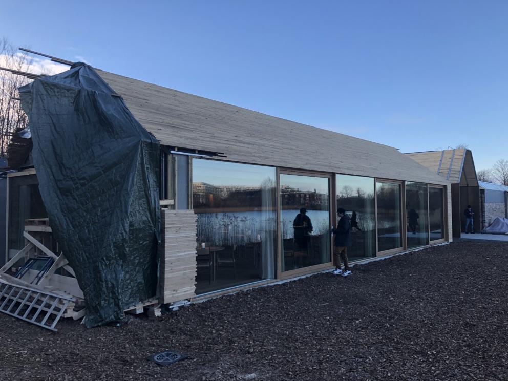 Photogallery






Noma 2.0 is in Christianshavn, the same neighbourhood as the first Noma. They’re 1.5 km apart, a 15 minutes’ walk. This picture shows the distance: to the right, there’s the warehouse of the old location (in Strandgade 93), to the left the smokestacks of Amager Bakke, the futuristic incinerator below which stands the new Noma (in Refshalevej 96)









Weather permitting, you can have a peaceful walk between the previous Noma to today’s Noma 









The new Noma is on an isthmus surrounded by canals. In the future they also want to reclaim some small parts for hydroponic farming









Bucolic scene with incinerator









Bikes left outside Noma. It’s the favourite means of transport among employees and interns









The long path taking you to the restaurant. The fence on the left shows how works are still in progress









On the two sides of the path there are the two new sections of the "Noma village", each with its specialty: grill, hot dishes, snacks, fermentations... In one month’s time, behind the fence we’ll have greenhouses, the test kitchen and the bread making area









To the left, before arriving at the restaurant, the future test kitchen. This will be run by Danish Mette Søberg with Riccardo Canella. "My first challenge?", reveals the latter, for a long time sous chef here, "is to work on the extraction of essential oils" 









The future Test Kitchen









The temporary gangway to the restaurant









Looking from the door to the restaurant, there’s a lake and the smokestacks puffing vapour from the Amager Bakke incinerator. It’s a futuristic project, both in terms of sustainability and architecture. It’s also known as Amager Slope or Copenhill, and its author is starchitect Bjarke Ingels, the same who designed the new Noma. Gradually opened in 2017, it transforms waste into electricity. The goal is to donate electricity to 62500 houses and hot water to 160000. It’s part of an ambitious project to transform Copenhagen into the first city in the world in terms of zero carbon dioxide emissions by 2025. By autumn this year, Amager Slope should open its ski slope, a climbing wall and a hiking track. You’ll be able to slalom on top of the incinerator









The windows from the dining room






