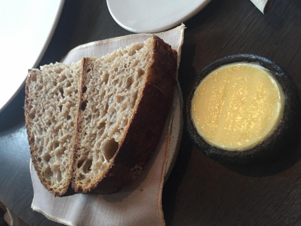 Photogallery






The traditional welcome at Noma: the chefs from the service kitchen greet the guests. In the middle, Italian Riccardo Canella, who will help us describing the last menu in detail (photo gallery by Luca Iaccarino and Gabriele Zanatta)









Warm broth of cloudberries. It’s the last welcome dish at Noma. It’s cold outside but as soon as you sit inside, you get warm thanks to this hot broth made with cloudberries enriched with rhubarb root oil. You dip a bouquet of hay, lemon thyme and mountain pine. Corroborating









Riccardo Canella brings a preview of what will follow









It’s a dish with seafood, including a huge (and alive) king crab, sea urchins and oysters









Apple of the season









Apple of the season. Once you open the shell, many small apple parisienne appear in a juice made with centrifuged, clarified apple scraps, seasoned with verbena and thyme. There’s also a purée of apples fermented in broth. The dish is finished with oxalis flowers, tagete and oil of blackcurrant wood, made by beating the blackcurrant branches with a hammer, so as to extract their essential oils. A very pleasant dish despite its complex idea.

"The first time I saw it ", added Canella, "I was struck because it reminded me of the stuffed apples they used to make at restaurant Bulesca in Selvazzano, Padua, in the early Eighties. Except in that case it was filled with rolls made with granny smith apple and prosciutto from Montagnana" 









Fresh sliced scallop. It’s a scallop taken from the fish tank and shelled a few moments before serving it. It is then sliced, brushed with a reduction of vegetable whipped butter with cucumber centrifuge juice, then reduced, and piso broth (that is to say miso with dehydrated peas).

The technique is the same used for the broth ice-clarification made famous in the Nineties by Heston Blumenthal at Fat Duck: you freeze the broth then hang a table cloth so as to obtain the “pure” part of the liquid. A trick that adds the same satisfying sensation of a meat jus to a vegetable broth. The scallop is finally dipped into a classic mussel broth. An incredible mouthful of seafood and umami









A Winter Platter. Hidden among the leaves, are four edible tastings









He sums up in just one dish 4 snacks that he might would have served separately a few years back. A fun and tasty idea. In detail:

At 6 o’clock: Pear pressed in fermented red gooseberry with fully ripe common sea buckthorn. It’s a rather tart ensemble made sweeter by piso (again miso made with dried peas) seasoned with coriander seeds (supplied by Redzepi’s historic supplier Soren Wiuff). The external thinner leaf is a peel made with chicken broth and beech leaves preserved in vinegar.

10 o'clock: crispy black currant leaf-shaped sandwich, seasoned with yogurt, kombucha, elderberry flowers and red oxalis 

12 o'clock: malt branch with nasturtium leaves, creme fraiche, salt aromatised with pine and ants

4 o'clock: black garlic leaf with salt aromatised with kelp, a Japanese seaweed 









A detail of the malt branch, with well visible ants. At Noma, the study of the aromatic contribution given by formic acid to dishes continues. And even the service acquires elegance: in the past you might have seen ants floating in a few dishes. This is no longer the case









A Tupperware from the "ant library", on the first floor at Strangade









Radish pie. It’s an emblem of the latest menus at Noma. It’s been in the menu for almost a year. In the crunchy disc on the bottom there’s kelp seaweed and a vegetable reduction made with coriander pesto. The radish roses (22, no more, no less) were pressed in beetroot juice. Another formidable tasting









Interns roll the radish roses together, on the top floor at Noma. Loud music and teamwork help making the job less alienating






