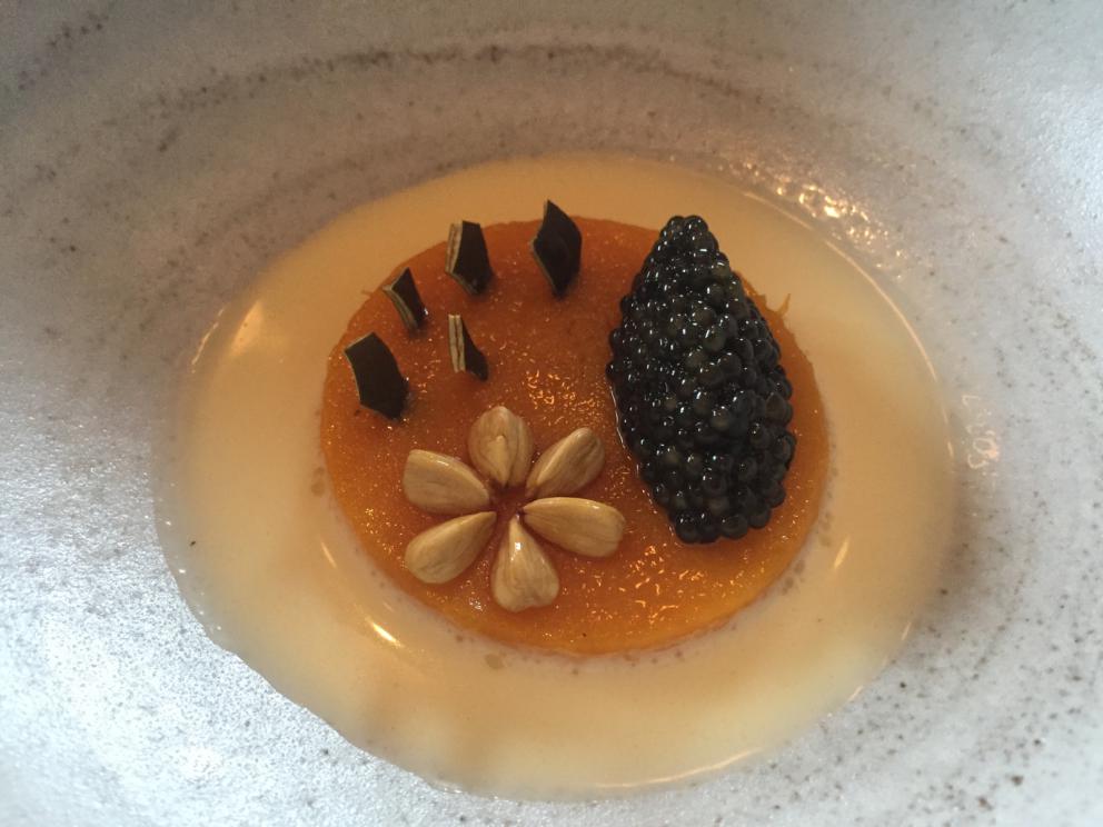 Photogallery






The traditional welcome at Noma: the chefs from the service kitchen greet the guests. In the middle, Italian Riccardo Canella, who will help us describing the last menu in detail (photo gallery by Luca Iaccarino and Gabriele Zanatta)









Warm broth of cloudberries. It’s the last welcome dish at Noma. It’s cold outside but as soon as you sit inside, you get warm thanks to this hot broth made with cloudberries enriched with rhubarb root oil. You dip a bouquet of hay, lemon thyme and mountain pine. Corroborating









Riccardo Canella brings a preview of what will follow









It’s a dish with seafood, including a huge (and alive) king crab, sea urchins and oysters









Apple of the season









Apple of the season. Once you open the shell, many small apple parisienne appear in a juice made with centrifuged, clarified apple scraps, seasoned with verbena and thyme. There’s also a purée of apples fermented in broth. The dish is finished with oxalis flowers, tagete and oil of blackcurrant wood, made by beating the blackcurrant branches with a hammer, so as to extract their essential oils. A very pleasant dish despite its complex idea.

"The first time I saw it ", added Canella, "I was struck because it reminded me of the stuffed apples they used to make at restaurant Bulesca in Selvazzano, Padua, in the early Eighties. Except in that case it was filled with rolls made with granny smith apple and prosciutto from Montagnana" 









Fresh sliced scallop. It’s a scallop taken from the fish tank and shelled a few moments before serving it. It is then sliced, brushed with a reduction of vegetable whipped butter with cucumber centrifuge juice, then reduced, and piso broth (that is to say miso with dehydrated peas).

The technique is the same used for the broth ice-clarification made famous in the Nineties by Heston Blumenthal at Fat Duck: you freeze the broth then hang a table cloth so as to obtain the “pure” part of the liquid. A trick that adds the same satisfying sensation of a meat jus to a vegetable broth. The scallop is finally dipped into a classic mussel broth. An incredible mouthful of seafood and umami









A Winter Platter. Hidden among the leaves, are four edible tastings









He sums up in just one dish 4 snacks that he might would have served separately a few years back. A fun and tasty idea. In detail:

At 6 o’clock: Pear pressed in fermented red gooseberry with fully ripe common sea buckthorn. It’s a rather tart ensemble made sweeter by piso (again miso made with dried peas) seasoned with coriander seeds (supplied by Redzepi’s historic supplier Soren Wiuff). The external thinner leaf is a peel made with chicken broth and beech leaves preserved in vinegar.

10 o'clock: crispy black currant leaf-shaped sandwich, seasoned with yogurt, kombucha, elderberry flowers and red oxalis 

12 o'clock: malt branch with nasturtium leaves, creme fraiche, salt aromatised with pine and ants

4 o'clock: black garlic leaf with salt aromatised with kelp, a Japanese seaweed 









A detail of the malt branch, with well visible ants. At Noma, the study of the aromatic contribution given by formic acid to dishes continues. And even the service acquires elegance: in the past you might have seen ants floating in a few dishes. This is no longer the case









A Tupperware from the "ant library", on the first floor at Strangade









Radish pie. It’s an emblem of the latest menus at Noma. It’s been in the menu for almost a year. In the crunchy disc on the bottom there’s kelp seaweed and a vegetable reduction made with coriander pesto. The radish roses (22, no more, no less) were pressed in beetroot juice. Another formidable tasting









Interns roll the radish roses together, on the top floor at Noma. Loud music and teamwork help making the job less alienating









Natural fermented bread of Øland wheat and hulless barley.  Øland wheat is Danish, with 83% hydration. “Nerd” bread maker Rasmus Kristensen is obsessed with it: even though it could last a week, he bakes it fresh every day for the two services (see the interview on Vice). It has a crispy yet soft crust, and it’s a great progress compared to the early bread making at the restaurant.

The salted butter is instead Norwegian Røros, according to some “the best butter in the world”. One of the most extraordinary pairings ever tasted. We asked for an encore









Cooked oyster and broccoli stems. The oyster is blanched for two minutes and placed on a shell with the edges powdered with salicornia. Between the broccoli and the oyster there are some diced stalks of sorrel. There’s a reduction with kelp seaweed, whisked with butter, thyme and “capers” made with white currants [they’re not real capers but the currants are preserved for a year in 2% salt, like capers). The sauce for the oyster is made with white gooseberries. An artwork, but less convincing than the other tastings









Sea urchin and cabbage. It’s a cabbage leaf pressed with hazelnut oil, filled with sea urchin roe and seasoned with pine vinegar, water from fermented porcini and pickled chanterelle mushrooms. On top, there’s parsley pesto and salt aromatised with pine. It’s a dish that changes greatly according to the season: compared to September, the leaves are now smaller and woodier. Two extraordinary mouthfuls, the result of a rather simple intuition









Sea urchin and cabbage, a detail. Northern sea urchins are creamier than Italian ones. A blast









Langoustine, onion and lavender. The langoustine is the precious one from the Far Oer Islands. The onion is Danish and grilled, steamed in a vacuum bag with Koji oil (blended rapeseed oil with fermented oil) and then grilled again, only slightly, so as to get a golden nuance. The langoustine is instead cooked in its shell, seared in butter at 60°C for 2 minutes, then peeled, cut and served. Rose oil, vinegar made with lovage sprouts and dried lavender complete the picture. The dish is focused on the sweetness given by the onion, which has a similar texture to the langoustine. Very nice






