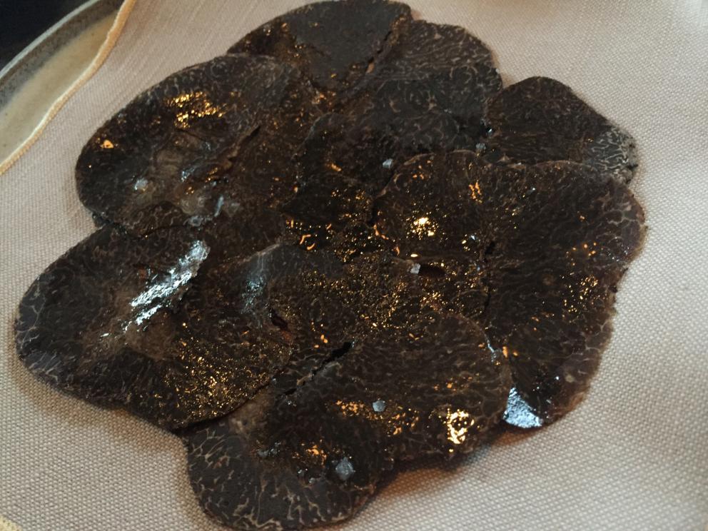 Photogallery






The traditional welcome at Noma: the chefs from the service kitchen greet the guests. In the middle, Italian Riccardo Canella, who will help us describing the last menu in detail (photo gallery by Luca Iaccarino and Gabriele Zanatta)









Warm broth of cloudberries. It’s the last welcome dish at Noma. It’s cold outside but as soon as you sit inside, you get warm thanks to this hot broth made with cloudberries enriched with rhubarb root oil. You dip a bouquet of hay, lemon thyme and mountain pine. Corroborating









Riccardo Canella brings a preview of what will follow









It’s a dish with seafood, including a huge (and alive) king crab, sea urchins and oysters









Apple of the season









Apple of the season. Once you open the shell, many small apple parisienne appear in a juice made with centrifuged, clarified apple scraps, seasoned with verbena and thyme. There’s also a purée of apples fermented in broth. The dish is finished with oxalis flowers, tagete and oil of blackcurrant wood, made by beating the blackcurrant branches with a hammer, so as to extract their essential oils. A very pleasant dish despite its complex idea.

"The first time I saw it ", added Canella, "I was struck because it reminded me of the stuffed apples they used to make at restaurant Bulesca in Selvazzano, Padua, in the early Eighties. Except in that case it was filled with rolls made with granny smith apple and prosciutto from Montagnana" 









Fresh sliced scallop. It’s a scallop taken from the fish tank and shelled a few moments before serving it. It is then sliced, brushed with a reduction of vegetable whipped butter with cucumber centrifuge juice, then reduced, and piso broth (that is to say miso with dehydrated peas).

The technique is the same used for the broth ice-clarification made famous in the Nineties by Heston Blumenthal at Fat Duck: you freeze the broth then hang a table cloth so as to obtain the “pure” part of the liquid. A trick that adds the same satisfying sensation of a meat jus to a vegetable broth. The scallop is finally dipped into a classic mussel broth. An incredible mouthful of seafood and umami









A Winter Platter. Hidden among the leaves, are four edible tastings









He sums up in just one dish 4 snacks that he might would have served separately a few years back. A fun and tasty idea. In detail:

At 6 o’clock: Pear pressed in fermented red gooseberry with fully ripe common sea buckthorn. It’s a rather tart ensemble made sweeter by piso (again miso made with dried peas) seasoned with coriander seeds (supplied by Redzepi’s historic supplier Soren Wiuff). The external thinner leaf is a peel made with chicken broth and beech leaves preserved in vinegar.

10 o'clock: crispy black currant leaf-shaped sandwich, seasoned with yogurt, kombucha, elderberry flowers and red oxalis 

12 o'clock: malt branch with nasturtium leaves, creme fraiche, salt aromatised with pine and ants

4 o'clock: black garlic leaf with salt aromatised with kelp, a Japanese seaweed 









A detail of the malt branch, with well visible ants. At Noma, the study of the aromatic contribution given by formic acid to dishes continues. And even the service acquires elegance: in the past you might have seen ants floating in a few dishes. This is no longer the case









A Tupperware from the "ant library", on the first floor at Strangade









Radish pie. It’s an emblem of the latest menus at Noma. It’s been in the menu for almost a year. In the crunchy disc on the bottom there’s kelp seaweed and a vegetable reduction made with coriander pesto. The radish roses (22, no more, no less) were pressed in beetroot juice. Another formidable tasting









Interns roll the radish roses together, on the top floor at Noma. Loud music and teamwork help making the job less alienating









Natural fermented bread of Øland wheat and hulless barley.  Øland wheat is Danish, with 83% hydration. “Nerd” bread maker Rasmus Kristensen is obsessed with it: even though it could last a week, he bakes it fresh every day for the two services (see the interview on Vice). It has a crispy yet soft crust, and it’s a great progress compared to the early bread making at the restaurant.

The salted butter is instead Norwegian Røros, according to some “the best butter in the world”. One of the most extraordinary pairings ever tasted. We asked for an encore









Cooked oyster and broccoli stems. The oyster is blanched for two minutes and placed on a shell with the edges powdered with salicornia. Between the broccoli and the oyster there are some diced stalks of sorrel. There’s a reduction with kelp seaweed, whisked with butter, thyme and “capers” made with white currants [they’re not real capers but the currants are preserved for a year in 2% salt, like capers). The sauce for the oyster is made with white gooseberries. An artwork, but less convincing than the other tastings









Sea urchin and cabbage. It’s a cabbage leaf pressed with hazelnut oil, filled with sea urchin roe and seasoned with pine vinegar, water from fermented porcini and pickled chanterelle mushrooms. On top, there’s parsley pesto and salt aromatised with pine. It’s a dish that changes greatly according to the season: compared to September, the leaves are now smaller and woodier. Two extraordinary mouthfuls, the result of a rather simple intuition









Sea urchin and cabbage, a detail. Northern sea urchins are creamier than Italian ones. A blast









Langoustine, onion and lavender. The langoustine is the precious one from the Far Oer Islands. The onion is Danish and grilled, steamed in a vacuum bag with Koji oil (blended rapeseed oil with fermented oil) and then grilled again, only slightly, so as to get a golden nuance. The langoustine is instead cooked in its shell, seared in butter at 60°C for 2 minutes, then peeled, cut and served. Rose oil, vinegar made with lovage sprouts and dried lavender complete the picture. The dish is focused on the sweetness given by the onion, which has a similar texture to the langoustine. Very nice









Butternut squash, barley and caviar. The butternut squash is confit in oil aromatised with seaweeds later roasted and placed on top. It is completed with beechnuts, a sauce made with fermented barley and butter and a handful of Finnish caviar. A sweet interlude









Claws and heads of a langoustine from the Far Oer Islands, cut in two. The heads of the langoustine are braised with a paste made with the entrails of the langoustine and a reduction of yeast and thyme and lemon on top. A very pleasing neo-primitive tasting with a strong dose of umami









Steamed king crab and egg yolk sauce. A new take on a classic Japanese dish, learnt in Tokyo and applied in Australia to a snow crab. Global nomadism made Redzepi’s cuisine rounder, less extreme than in the past









In this case, the king crab is steamed and seasoned with smoked salt. The sauce is made with egg yolks marinated in beef garum, a trick that gives a significant sour component to the recipe. Finally, there’s a seasoning made of butter and piso. An interesting depth









Charred greens with a scallop paste. There are plenty of seasonal herbs and vegetables, in this case cabbage, black cabbage, sage, verbena, nettle and the first sprouts of wild garlic. The caramel is made with a purée of fresh scallop, rolled out for 48 hours on a silpat. Once dehydrated, it becomes dark orange. They then blend it, powder it, mix it with bees’ wax and rapeseed oil. Finally they cover the caramel with horseradish juice. Another interlocutory tasting, fun and very much appreciated thanks to the crispiness and the bitter-sweet herbs. Trivia fact: the dish is served with a steak knife. That is to say: herb is the new meat









Roasted Bone Marrow. It’s not the first time they serve grilled bone marrow at Noma, legitimised in fine dining by English Fergus Henderson. What’s new is the way in which they have been serving it in Copenhagen for around one month now: the bone marrow is surrounded by many small plates and garnishes, so guests can enrich it to their liking. A similar idea to what Paolo Lopriore does every day at Portico in Appiano Gentile

 














Among the garnishes that can enrich the bone marrow are pickles, wild mushrooms with beef garum paste, wild herb paste, fresh garlic, leek flower sprouts preserved in salt and salt aromatised with roasted seaweed









Other complements for the bone marrow: to the right, chicken "skin" made with dehydrated jus ("the skin is the best part of a chicken", once Redzepi demonstrated in Belgium) and next to it a vegetal reduction with black garlic






