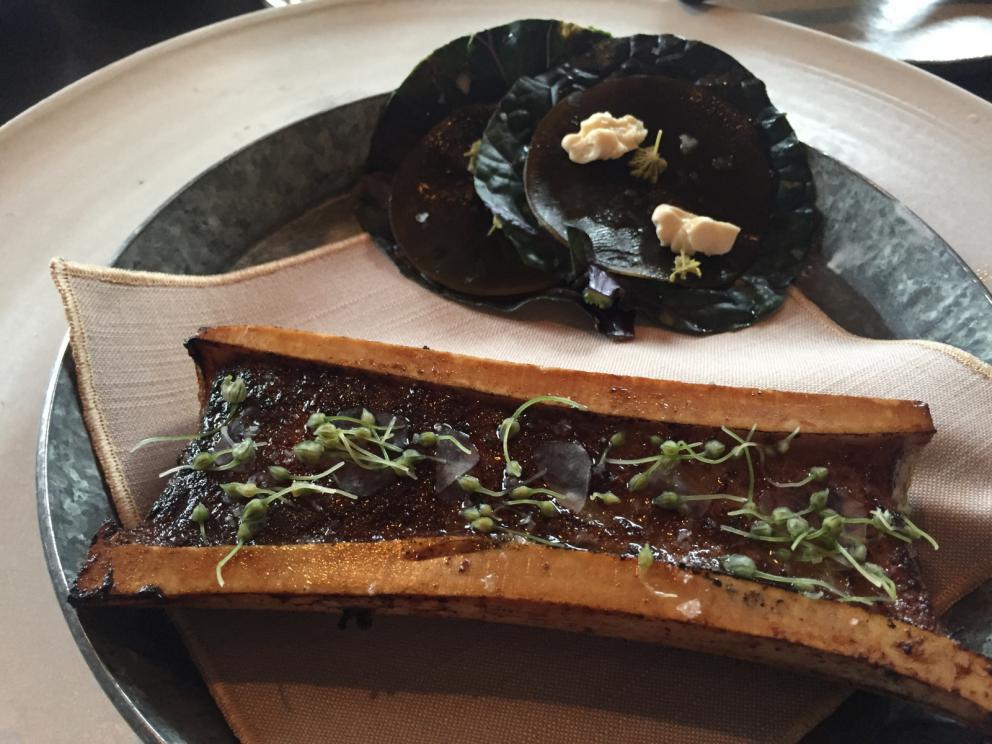 Photogallery






The traditional welcome at Noma: the chefs from the service kitchen greet the guests. In the middle, Italian Riccardo Canella, who will help us describing the last menu in detail (photo gallery by Luca Iaccarino and Gabriele Zanatta)









Warm broth of cloudberries. It’s the last welcome dish at Noma. It’s cold outside but as soon as you sit inside, you get warm thanks to this hot broth made with cloudberries enriched with rhubarb root oil. You dip a bouquet of hay, lemon thyme and mountain pine. Corroborating









Riccardo Canella brings a preview of what will follow









It’s a dish with seafood, including a huge (and alive) king crab, sea urchins and oysters









Apple of the season









Apple of the season. Once you open the shell, many small apple parisienne appear in a juice made with centrifuged, clarified apple scraps, seasoned with verbena and thyme. There’s also a purée of apples fermented in broth. The dish is finished with oxalis flowers, tagete and oil of blackcurrant wood, made by beating the blackcurrant branches with a hammer, so as to extract their essential oils. A very pleasant dish despite its complex idea.

"The first time I saw it ", added Canella, "I was struck because it reminded me of the stuffed apples they used to make at restaurant Bulesca in Selvazzano, Padua, in the early Eighties. Except in that case it was filled with rolls made with granny smith apple and prosciutto from Montagnana" 









Fresh sliced scallop. It’s a scallop taken from the fish tank and shelled a few moments before serving it. It is then sliced, brushed with a reduction of vegetable whipped butter with cucumber centrifuge juice, then reduced, and piso broth (that is to say miso with dehydrated peas).

The technique is the same used for the broth ice-clarification made famous in the Nineties by Heston Blumenthal at Fat Duck: you freeze the broth then hang a table cloth so as to obtain the “pure” part of the liquid. A trick that adds the same satisfying sensation of a meat jus to a vegetable broth. The scallop is finally dipped into a classic mussel broth. An incredible mouthful of seafood and umami









A Winter Platter. Hidden among the leaves, are four edible tastings









He sums up in just one dish 4 snacks that he might would have served separately a few years back. A fun and tasty idea. In detail:

At 6 o’clock: Pear pressed in fermented red gooseberry with fully ripe common sea buckthorn. It’s a rather tart ensemble made sweeter by piso (again miso made with dried peas) seasoned with coriander seeds (supplied by Redzepi’s historic supplier Soren Wiuff). The external thinner leaf is a peel made with chicken broth and beech leaves preserved in vinegar.

10 o'clock: crispy black currant leaf-shaped sandwich, seasoned with yogurt, kombucha, elderberry flowers and red oxalis 

12 o'clock: malt branch with nasturtium leaves, creme fraiche, salt aromatised with pine and ants

4 o'clock: black garlic leaf with salt aromatised with kelp, a Japanese seaweed 









A detail of the malt branch, with well visible ants. At Noma, the study of the aromatic contribution given by formic acid to dishes continues. And even the service acquires elegance: in the past you might have seen ants floating in a few dishes. This is no longer the case









A Tupperware from the "ant library", on the first floor at Strangade









Radish pie. It’s an emblem of the latest menus at Noma. It’s been in the menu for almost a year. In the crunchy disc on the bottom there’s kelp seaweed and a vegetable reduction made with coriander pesto. The radish roses (22, no more, no less) were pressed in beetroot juice. Another formidable tasting









Interns roll the radish roses together, on the top floor at Noma. Loud music and teamwork help making the job less alienating









Natural fermented bread of Øland wheat and hulless barley.  Øland wheat is Danish, with 83% hydration. “Nerd” bread maker Rasmus Kristensen is obsessed with it: even though it could last a week, he bakes it fresh every day for the two services (see the interview on Vice). It has a crispy yet soft crust, and it’s a great progress compared to the early bread making at the restaurant.

The salted butter is instead Norwegian Røros, according to some “the best butter in the world”. One of the most extraordinary pairings ever tasted. We asked for an encore









Cooked oyster and broccoli stems. The oyster is blanched for two minutes and placed on a shell with the edges powdered with salicornia. Between the broccoli and the oyster there are some diced stalks of sorrel. There’s a reduction with kelp seaweed, whisked with butter, thyme and “capers” made with white currants [they’re not real capers but the currants are preserved for a year in 2% salt, like capers). The sauce for the oyster is made with white gooseberries. An artwork, but less convincing than the other tastings









Sea urchin and cabbage. It’s a cabbage leaf pressed with hazelnut oil, filled with sea urchin roe and seasoned with pine vinegar, water from fermented porcini and pickled chanterelle mushrooms. On top, there’s parsley pesto and salt aromatised with pine. It’s a dish that changes greatly according to the season: compared to September, the leaves are now smaller and woodier. Two extraordinary mouthfuls, the result of a rather simple intuition









Sea urchin and cabbage, a detail. Northern sea urchins are creamier than Italian ones. A blast









Langoustine, onion and lavender. The langoustine is the precious one from the Far Oer Islands. The onion is Danish and grilled, steamed in a vacuum bag with Koji oil (blended rapeseed oil with fermented oil) and then grilled again, only slightly, so as to get a golden nuance. The langoustine is instead cooked in its shell, seared in butter at 60°C for 2 minutes, then peeled, cut and served. Rose oil, vinegar made with lovage sprouts and dried lavender complete the picture. The dish is focused on the sweetness given by the onion, which has a similar texture to the langoustine. Very nice









Butternut squash, barley and caviar. The butternut squash is confit in oil aromatised with seaweeds later roasted and placed on top. It is completed with beechnuts, a sauce made with fermented barley and butter and a handful of Finnish caviar. A sweet interlude









Claws and heads of a langoustine from the Far Oer Islands, cut in two. The heads of the langoustine are braised with a paste made with the entrails of the langoustine and a reduction of yeast and thyme and lemon on top. A very pleasing neo-primitive tasting with a strong dose of umami









Steamed king crab and egg yolk sauce. A new take on a classic Japanese dish, learnt in Tokyo and applied in Australia to a snow crab. Global nomadism made Redzepi’s cuisine rounder, less extreme than in the past









In this case, the king crab is steamed and seasoned with smoked salt. The sauce is made with egg yolks marinated in beef garum, a trick that gives a significant sour component to the recipe. Finally, there’s a seasoning made of butter and piso. An interesting depth









Charred greens with a scallop paste. There are plenty of seasonal herbs and vegetables, in this case cabbage, black cabbage, sage, verbena, nettle and the first sprouts of wild garlic. The caramel is made with a purée of fresh scallop, rolled out for 48 hours on a silpat. Once dehydrated, it becomes dark orange. They then blend it, powder it, mix it with bees’ wax and rapeseed oil. Finally they cover the caramel with horseradish juice. Another interlocutory tasting, fun and very much appreciated thanks to the crispiness and the bitter-sweet herbs. Trivia fact: the dish is served with a steak knife. That is to say: herb is the new meat









Roasted Bone Marrow. It’s not the first time they serve grilled bone marrow at Noma, legitimised in fine dining by English Fergus Henderson. What’s new is the way in which they have been serving it in Copenhagen for around one month now: the bone marrow is surrounded by many small plates and garnishes, so guests can enrich it to their liking. A similar idea to what Paolo Lopriore does every day at Portico in Appiano Gentile

 






