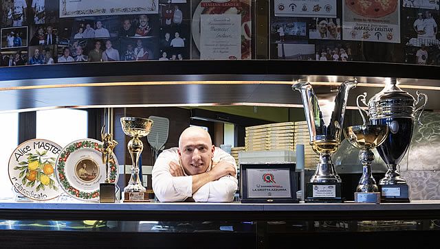 Reacting to the emergency: Cristian Marasco and the wood oven for pizza where he also bakes panettoni