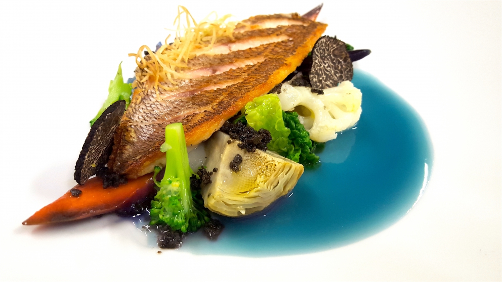 Galleria fotografica






Giuseppe Causarano, Locanda Gulfi, Chiaramonte Gulfi (Ragusa)

Palamita affumicata con foglie di vite, melagrana e azzeruole - Il piatto nasce dalle escursione sul letto del fiume Irminio, territorio sconosciuto e incontaminato che si addentra tra i Monti Iblei e sfocia a Donnalucata, dove poter raccogliere frutti, fiori e erbe selvatiche. Racconta la biodiversità di una terra fantastica come la Sicilia, lavorando uno dei pesci cosiddetti "poveri" come la palamita utilizzando dei prodotti dimenticati come le azzeruole. Il supporto del piatto disegnato da me e realizzato da un artigiano di Modica Giovanni Cerruto ricorda i ciottoli del fiume Irminio









Pino Cuttaia, La Madia, Licata (Agrigento)

Memoria visiva - E' il mio ricordo in una fetta di tonno rosso di Sicilia. Quando ero piccolo mio nonno, che era un ottimo cuoco, marinava con un po' di limone la paillard di vitello, prima di cuocerla. Faccio lo stesso col tonno, ma non lo cuocio anche se l'aspetto è simile, l'impressione della cottura è data proprio dalla marinatura. Se capita lascio che si trovi nel piatto anche il seme del limone: le mamme non si curavano mai se qualche seme cadeva nel piatto. Così presento la ricetta con una volontà evocativa di una quotidianità familiare, che è vita









Peppe Bonsignore, L’Oste e il Sacrestano, Licata (Agrigento)

Evoluzione di un'insalata di mare - Polpo cotto nel tè verde, seppia intagliata, gambero rosso di Licata il tutto servito su una crema di carote e un caramello di soia ottenuto dalla cottura dei cefalopodi. Ricordo che da bambino odiavo il polpo, fin quando mia mamma non decise di farlo con i sottaceti, dove primeggiava la carota, così iniziai ad assaggiarlo. Da quella memoria sono partito; così ho iniziato a lavorare sull'inserimento della carota. Tutto ebbe inizio nel 2009 e ogni anno modifichiamo la ricetta. Studiamo le cotture, aggiungiamo sempre qualche pesce, l’affumicatura del polpo viene fatta con ramoscelli di rosmarino secchi. La buccia di mandorla dona quel profumo di forno a legna che rievoca le nonne. Insomma oggi, nel 2016, dopo 7 anni, non diciamo mai che è una preparazione perfetta, perché è in continua evoluzione









Emanuele Russo, Le Lumìe, Marsala (Trapani)

Filetto di ombrina cotto a bassa temperatura con olio nuovo e miele di timo - Un piatto che unisce il gusto delicato del pesce alla dolcezza del miele e al piccante olio di Nocellara del Belice (la tradizione del pesce con l'innovazione della cottura a bassa temperatura)









Accursio Craparo, Accursio, Modica (Ragusa)

China su te - E' un divertimento che ammalia la vista prima di sorprendere il gusto: rompendo un bottone di seppia che racchiude il suo nero, restiamo ad ammirare la china che fluttua nel brodo di alghe, zenzero e tè nero, come nell'antica arte giapponese del suminagashi









Peppe Barone con Ninni Radicini, Fattoria delle Torri, Modica (Ragusa)

Sovrapposizioni autunnali di fava e fagiolo - Sovrapporre vuol dire in chiave compositiva la necessità, l'aspirazione di ogni essere umano di elevarsi, spingersi verso il cielo, in alto. D'altra parte congiungere due legumi di capitale importanza dà il senso del lavoro del cuoco, che è quello della sintesi di pensiero. Abbinarli alle erbe spontanee era una necessità oggi quasi obbligatoria. Il cuoco unisce sempre e mai separa









Corrado Assenza, Caffè Sicilia, Noto (Siracusa)

Prima che il sole scaldi - Un ragout di seppie e fave di cacao in salsa di broccolo viola, crema di peperoni grigliati. E poi due fili di ottima pasta. Concepito e realizzato col modo di fare di un pasticcere che lavora sul cibo pescando dolcezze e sapidità, costruendo consistenze e incroci con l'utilizzo di quanto la natura ci offre









Salvatore Vicari, Vicari, Noto (Siracusa)

Quaglia, rapa rossa e mela cotogna - Come in un bozzetto campestre ispirato al territorio di Noto, portiamo nel piatto un intero, piccolo ecosistema, che si muove dalle radici al cielo









Massimo Giaquinta, Cortile Arabo, Pachino (Siracusa)

Ostrica Porca - Da un pensiero "piccante" nasce questo piatto, un’ostrica dal mare alla terra, che racchiude l’eleganza della Sicilia. Tre sensazioni differenti ma inscindibili: passione, profumo e dolcezza. La passione trasposta dall'abbraccio tra ostrica e lardo di maialino nero dei Nebrodi, il profumo esaltato da menta peperita, erba citrica e polvere di arancia siciliana, la dolcezza viene sottolineata dalla confettura di gelso nero. Da gustare in un sol boccone - foto Rossana Brancato









Francesco Scarpulla, Brunaccini, Palermo

Ciacuni di patate e farina di tumminia con sparacelli (broccoletti siciliani), cozze, vongole e aria di mare - I ciacuni, gnocchi di patate simili a piccole “ciache” (ciottoli), rivisitazione di un grande classico della tradizione siciliana; la pasta coi frutti di mare con l’introduzione di un elemento terra, lo sparacello, e il tocco finale dellʼaria di mare, che rendono il piatto creativo e innovativo pur mantenendo i sapori tradizionali









Carmelo Trentacosti, Cuvée du Jour del Villa Igiea, Palermo

Triglia farcita con brunoise di verdurine, guazzetto di gamberi bianchi di nassa, crema di lattuga nostrana, bottarga di caviale Calvisius e cracker mediterraneo – E’ una “triglia in guazzetto”, versione moderna della triglia in umido alla messinese che facciamo in Sicilia









Gioacchino Gaglio, Gagini, Palermo

Baccalà profumato al miele di castagne Meli, ceci neri, germogli piccanti e castagne arrosto - Un piatto che racchiude i sapori e gli aromi della Sicilia d'inverno









Alberto Rizzo, Osteria dei Vespri, Palermo

Filetto di cavallo al ginepro, peperoni, patate, cipolla rossa e alici affumicate - Piatto che sintetizza le ispirazioni della mia cucina a cavallo fra le origini emiliane (la “vecchia di cavallo” della tradizione parmigiana) e le suggestioni del patrimonio di materie prime della ragione in cui sono nato (la Sicilia). Toni morbidi e sapidi che dialogano tra di loro in un connubio che realizza l’incontro intrigante fra mare e terra









Ciccio Sultano, Duomo, Ragusa

Pasta, zucca gialla sicula e mandorla pizzuta con ostrica - Una sublimazione del gusto, che racconta un territorio nell'incontro tra terra e mare









Claudio Ruta, La Fenice del Villa Carlotta, Ragusa

Ravioli di carote, scaglie di bottarga di tonno e brodo di pesce affumicato - Due pensieri. L’armonia perfetta nasce dai contrasti ben riusciti; l’equilibrio dei sapori, la materia prima e il rispetto della tradizione. Racconta un percorso di gusto che parte dalla tradizione per poi esaltare in un raffinato mix di verdure e pesce, l'eccellenza delle materie prime. Delicato ed essenziale






