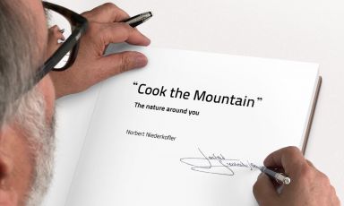 Norbert Niedekofler as he signs a copy of his Cook the Mountain - The nature around you, the book summarising the ideas of the chef from South Tyrol which permeate the fantastic food at his St.Hubertus, three stars in San Cassiano

