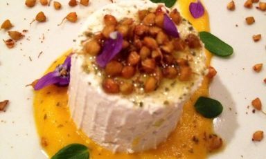 <i>Almond milk curd with a carrot cream made with wild herbs (primrose leaves, dandelion, portulaca) and dried buckwheat sprouts with bergamot and Sichuan pepper</i>. A fresh, creamy starter gfor an Easter vegan menu